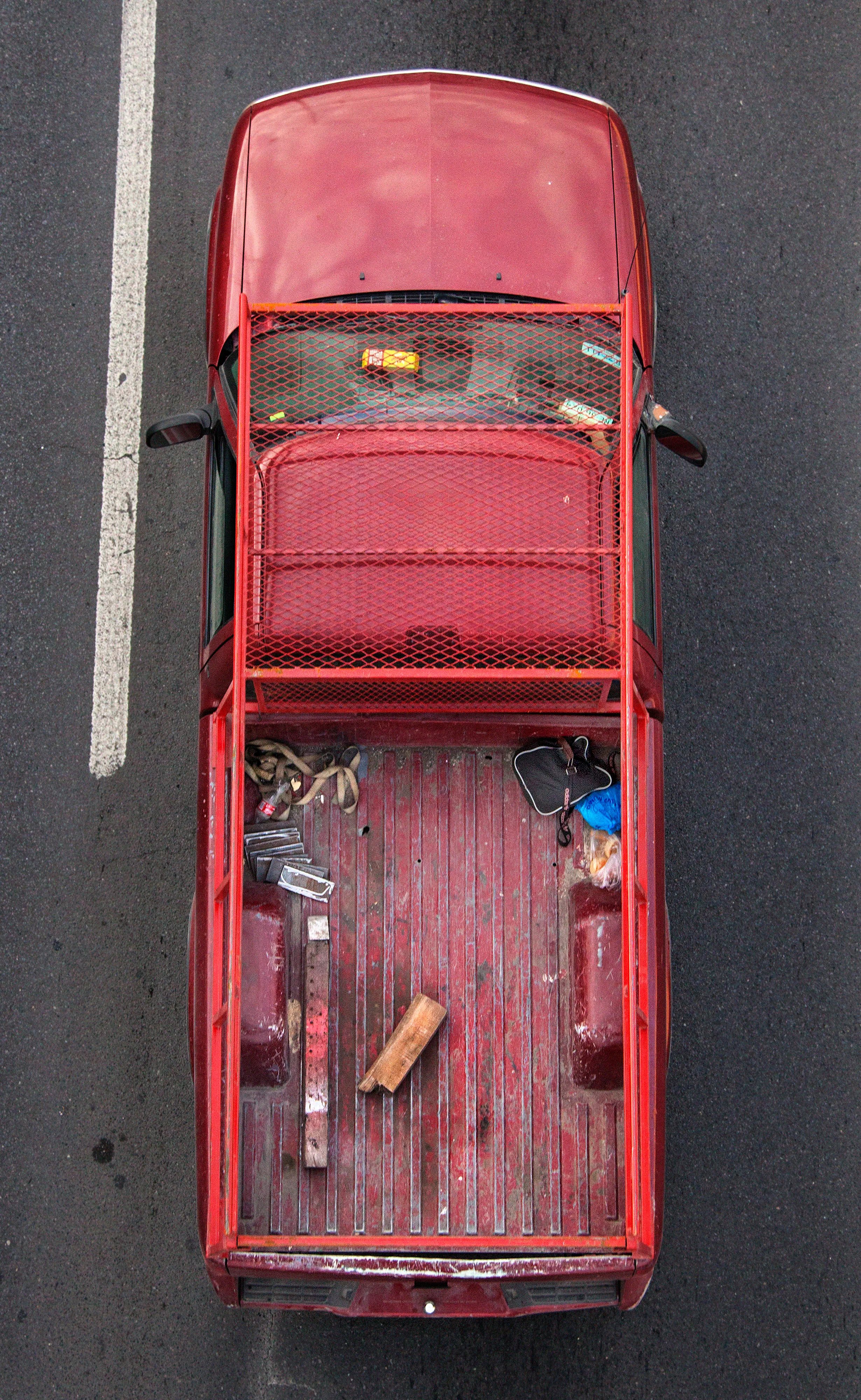 In Urban Transportation, Cartagena focuses on various modes of transportation used by workers in urban environments, particularly highlighting the ubiquitous red trucks. Shooting cars and trucks as they drive to work in the morning, Cartagena has been able to capture a stunning snapshot of what is the daily routine of a city. The colors and textures of the vehicles and objects, mixed with the contemporary idea of customizing vehicles make for arresting imagery of a contemporary Mexican city.