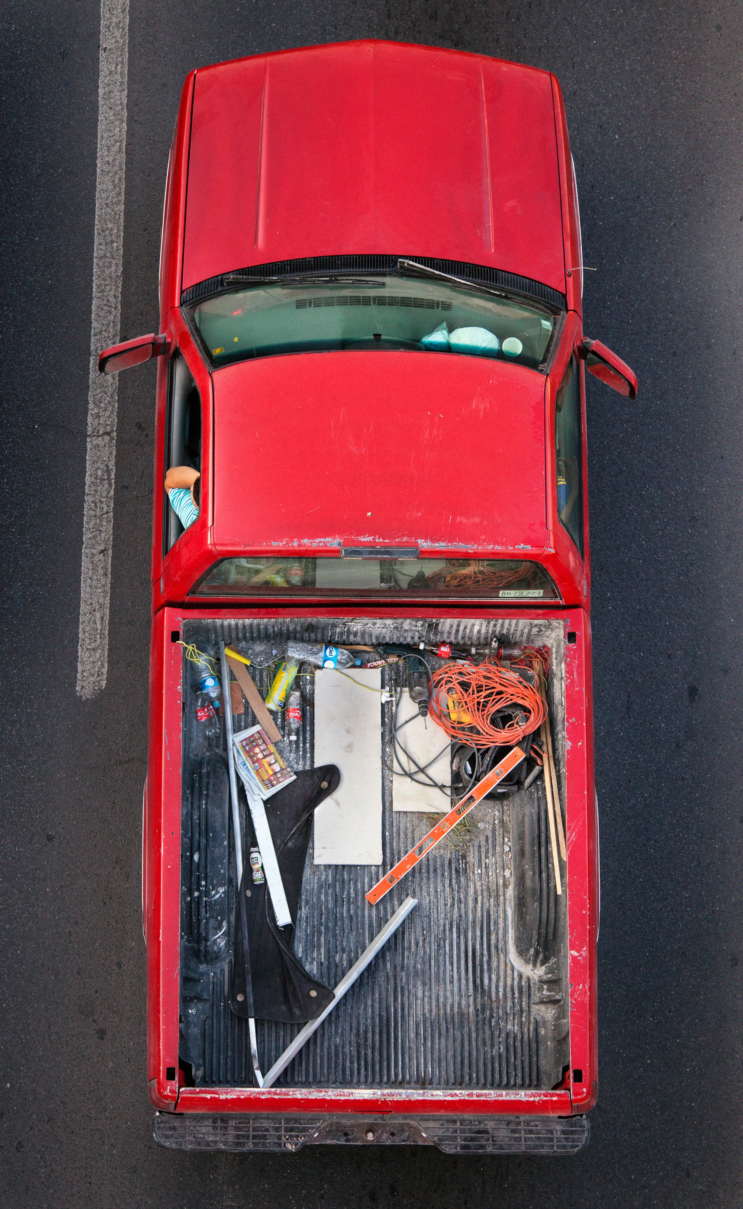 In Urban Transportation, Cartagena focuses on various modes of transportation used by workers in urban environments, particularly highlighting the ubiquitous red trucks. Shooting cars and trucks as they drive to work in the morning, Cartagena has been able to capture a stunning snapshot of what is the daily routine of a city. The colors and textures of the vehicles and objects, mixed with the contemporary idea of customizing vehicles make for arresting imagery of a contemporary Mexican city.