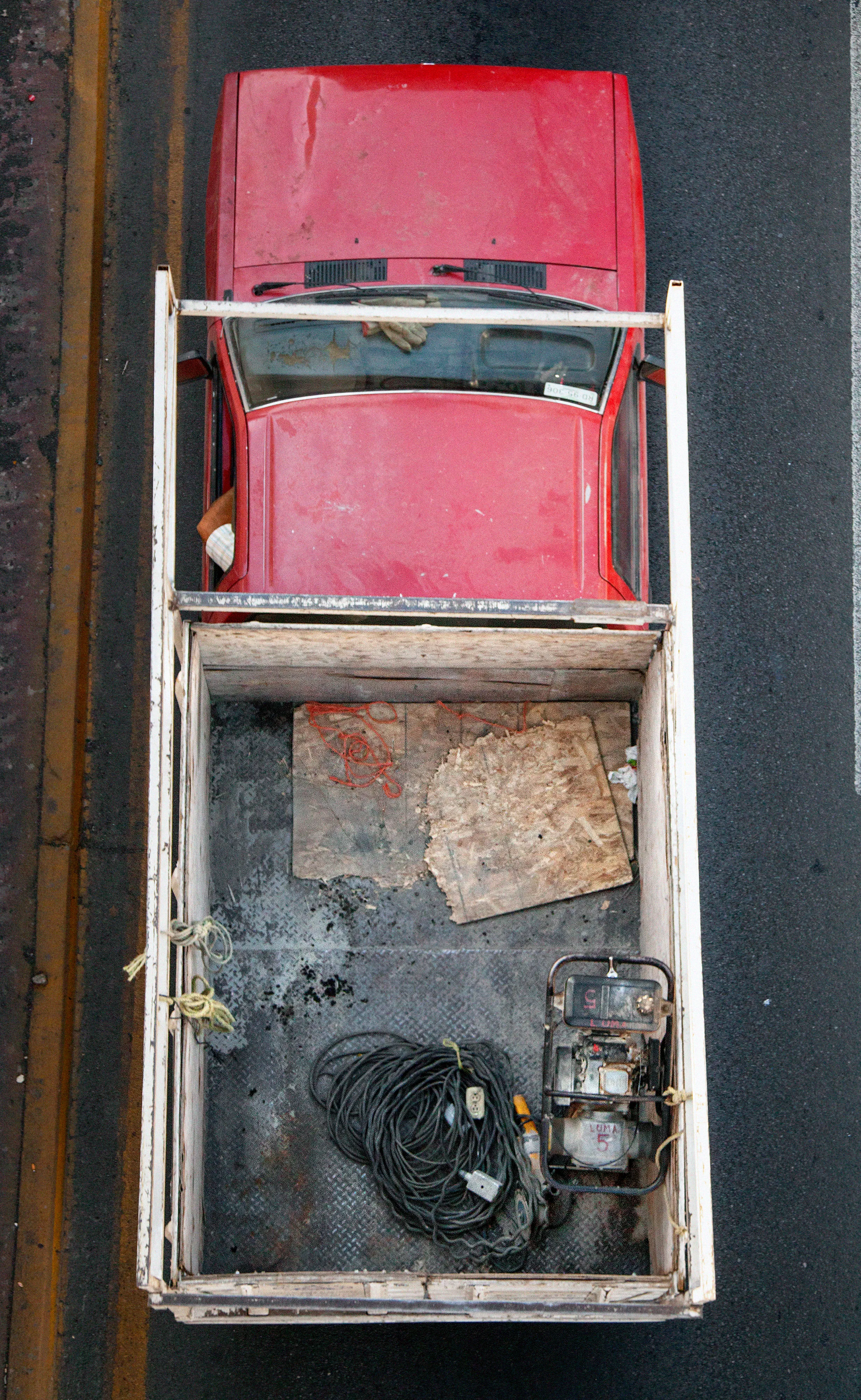 In Urban Transportation, Cartagena focuses on various modes of transportation used by workers in urban environments, particularly highlighting the ubiquitous red trucks. Shooting cars and trucks as they drive to work in the morning, Cartagena has been able to capture a stunning snapshot of what is the daily routine of a city. The colors and textures of the vehicles and objects, mixed with the contemporary idea of customizing vehicles make for arresting imagery of a contemporary Mexican city.