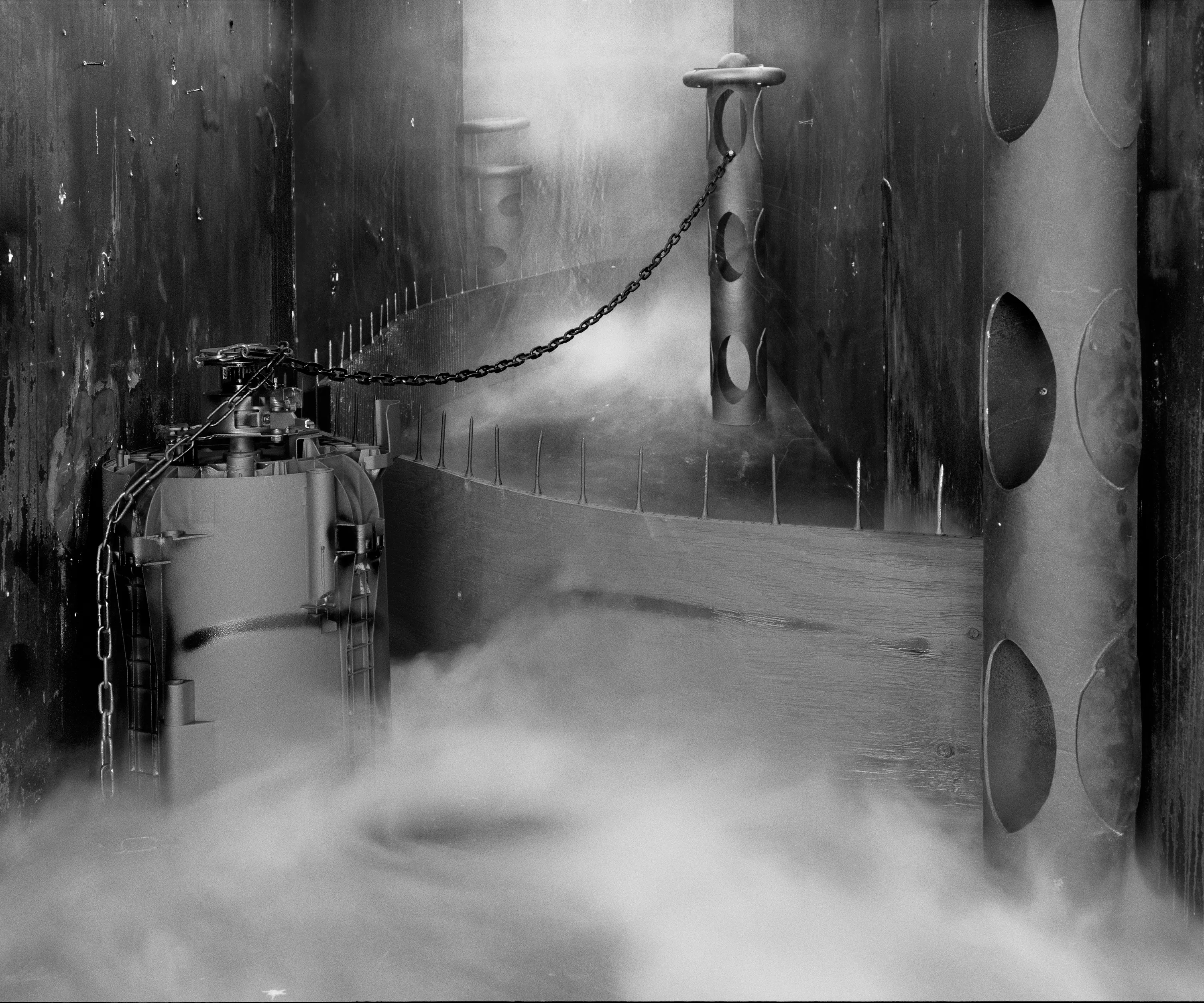 In conjunction with the exhibition in our physical gallery, Assembly presents “Afterwork” by Rodrigo Valenzuela. Based on the ghostly absence of workers in an indeterminate time and place, this work is at once futuristic and harking back to a century ago.

In staged sets suggesting abandoned factories, Valenzuela wishfully foments a revolution, enabling workers powerless in the face of relentless international movement of capital to flee or perhaps overrun their workplaces. As in a science-fiction universe where we feel a potential reality just out of reach of our present, Valenzuela’s scenes meld mechanical objects with steam or smoke, suggestive of steel manufacturing, a cloud of sweat-the only bodily proof of human toil-or a cinematic trope of futuristic atmosphere. In these eerily depopulated scenes, viewers are prompted to envision alternative possibilities to histories of workers dispossessed, or made obsolete, and industries that thrived on human pain.

Rodrigo Valenzuela is a Chilean-born, Los Angeles-based artist working in photography, video, painting, and installation. Not satisfied with the existing romanticism of blight and resurrection, Valenzuela opts for image making that is defiantly labor intensive and ambitious in scope. Detritus and industrial parts are scavenged over time, taken apart or reassembled, and transformed in the artist's own studio backdrops, then turned into flat images that confuse the viewer with scale shifts and multiple references. Using autobiographical threads to inform larger universal fields of experience, his work constructs narratives, scenes, and stories that point to the tensions found between the individual and communities. Much of his work deals with the experience of undocumented immigrants and laborers. His work has been exhibited internationally, including solo exhibitions at Lisa Kandlhofer Galerie, Vienna; the Ulrich Museum of Art, Wichita, KS; the Art Museum of the University of Memphis, TN; Klowdenmann Gallery, Los Angeles; the Frye Art Museum, Seattle; and Museo de Arte Contemporaneo, Santiago, Chile. In 2021, Valenuzlea was awarded a Guggenheim Fellowship in Photography and Smithsonian Artist Research Fellowship.