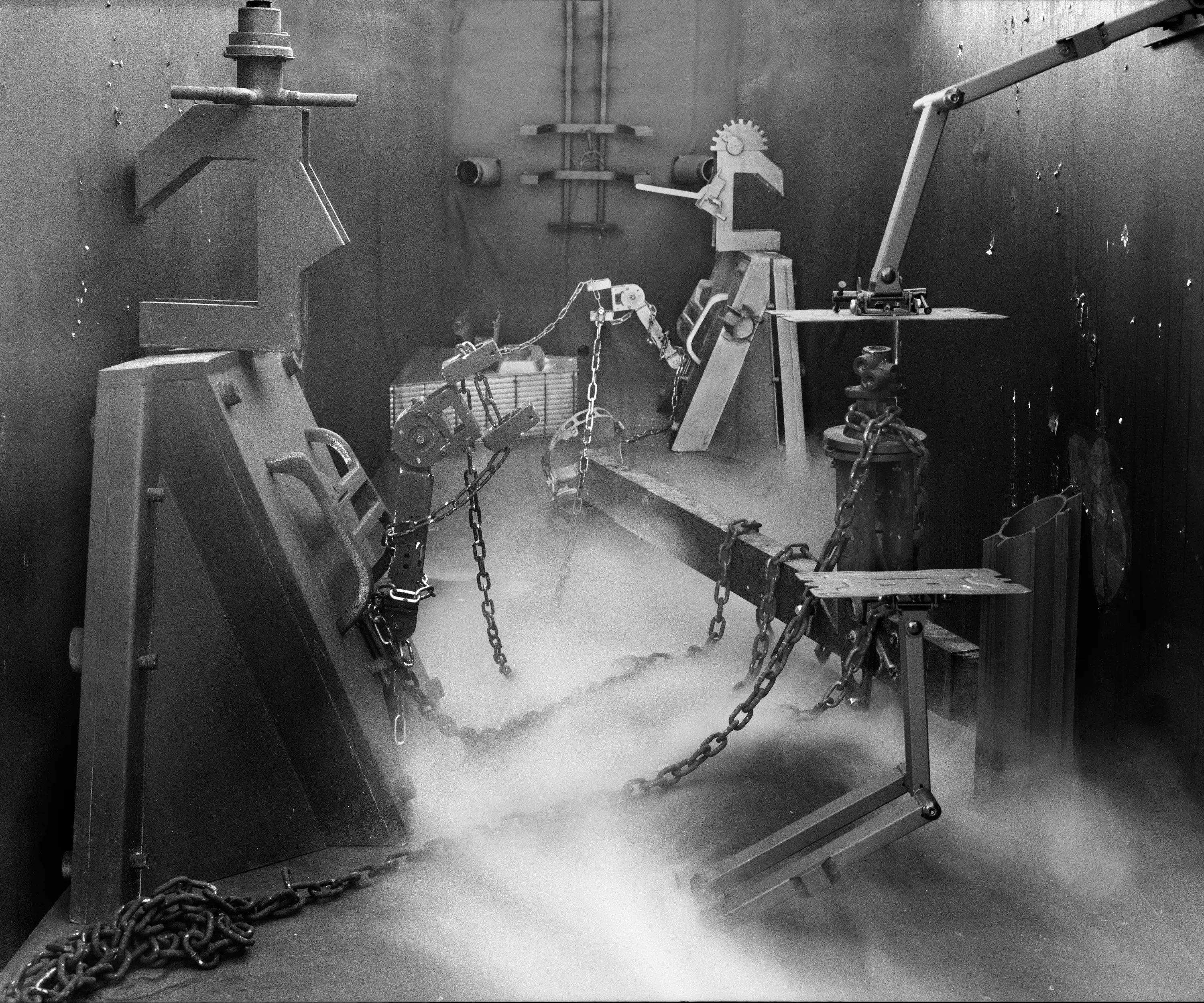 In conjunction with the exhibition in our physical gallery, Assembly presents “Afterwork” by Rodrigo Valenzuela. Based on the ghostly absence of workers in an indeterminate time and place, this work is at once futuristic and harking back to a century ago.

In staged sets suggesting abandoned factories, Valenzuela wishfully foments a revolution, enabling workers powerless in the face of relentless international movement of capital to flee or perhaps overrun their workplaces. As in a science-fiction universe where we feel a potential reality just out of reach of our present, Valenzuela’s scenes meld mechanical objects with steam or smoke, suggestive of steel manufacturing, a cloud of sweat-the only bodily proof of human toil-or a cinematic trope of futuristic atmosphere. In these eerily depopulated scenes, viewers are prompted to envision alternative possibilities to histories of workers dispossessed, or made obsolete, and industries that thrived on human pain.

Rodrigo Valenzuela is a Chilean-born, Los Angeles-based artist working in photography, video, painting, and installation. Not satisfied with the existing romanticism of blight and resurrection, Valenzuela opts for image making that is defiantly labor intensive and ambitious in scope. Detritus and industrial parts are scavenged over time, taken apart or reassembled, and transformed in the artist's own studio backdrops, then turned into flat images that confuse the viewer with scale shifts and multiple references. Using autobiographical threads to inform larger universal fields of experience, his work constructs narratives, scenes, and stories that point to the tensions found between the individual and communities. Much of his work deals with the experience of undocumented immigrants and laborers. His work has been exhibited internationally, including solo exhibitions at Lisa Kandlhofer Galerie, Vienna; the Ulrich Museum of Art, Wichita, KS; the Art Museum of the University of Memphis, TN; Klowdenmann Gallery, Los Angeles; the Frye Art Museum, Seattle; and Museo de Arte Contemporaneo, Santiago, Chile. In 2021, Valenuzlea was awarded a Guggenheim Fellowship in Photography and Smithsonian Artist Research Fellowship.