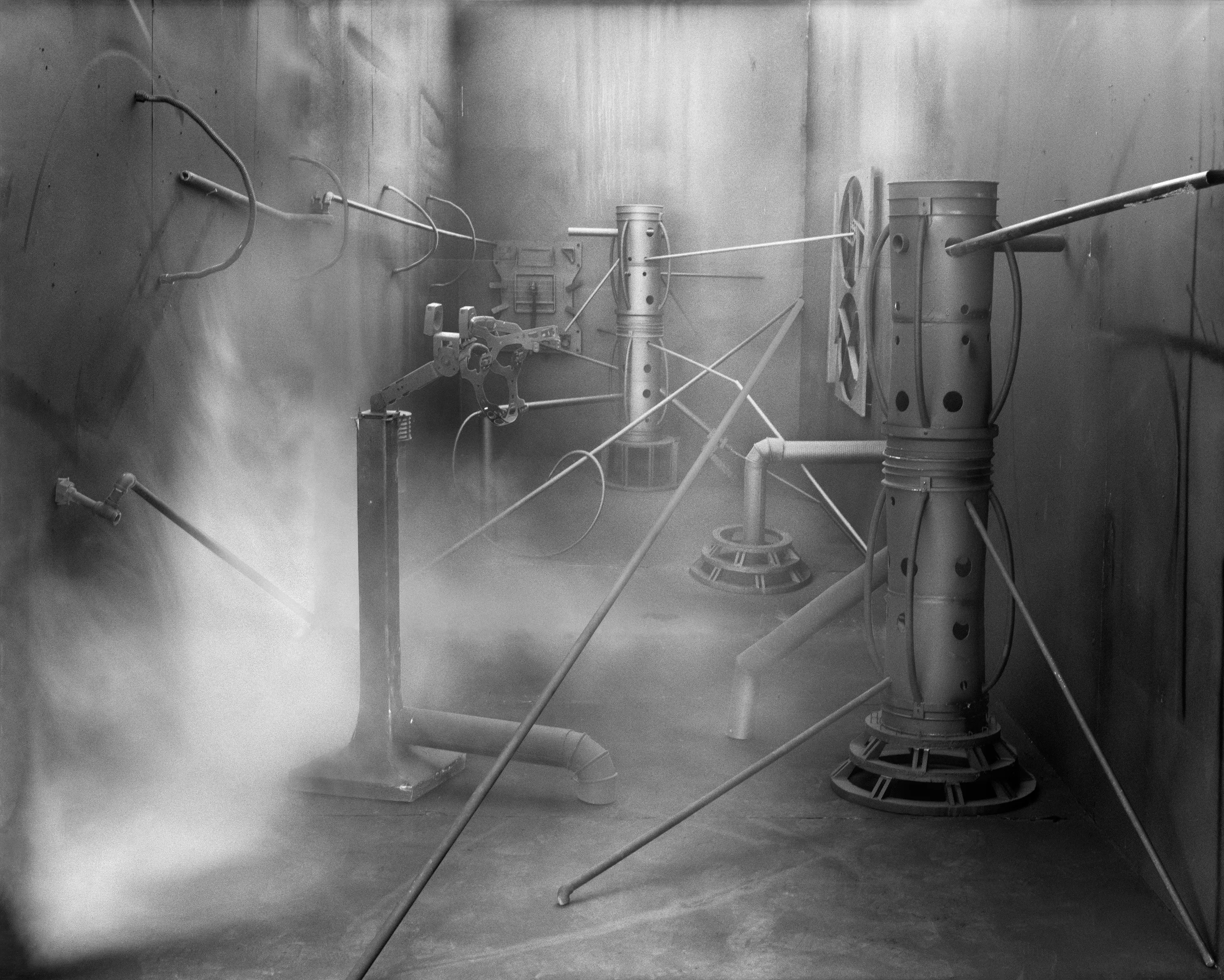 In conjunction with the exhibition in our physical gallery, Assembly presents “Afterwork” by Rodrigo Valenzuela. Based on the ghostly absence of workers in an indeterminate time and place, this work is at once futuristic and harking back to a century ago.

In staged sets suggesting abandoned factories, Valenzuela wishfully foments a revolution, enabling workers powerless in the face of relentless international movement of capital to flee or perhaps overrun their workplaces. As in a science-fiction universe where we feel a potential reality just out of reach of our present, Valenzuela’s scenes meld mechanical objects with steam or smoke, suggestive of steel manufacturing, a cloud of sweat-the only bodily proof of human toil-or a cinematic trope of futuristic atmosphere. In these eerily depopulated scenes, viewers are prompted to envision alternative possibilities to histories of workers dispossessed, or made obsolete, and industries that thrived on human pain.

Rodrigo Valenzuela is a Chilean-born, Los Angeles-based artist working in photography, video, painting, and installation. Not satisfied with the existing romanticism of blight and resurrection, Valenzuela opts for image making that is defiantly labor intensive and ambitious in scope. Detritus and industrial parts are scavenged over time, taken apart or reassembled, and transformed in the artist's own studio backdrops, then turned into flat images that confuse the viewer with scale shifts and multiple references. Using autobiographical threads to inform larger universal fields of experience, his work constructs narratives, scenes, and stories that point to the tensions found between the individual and communities. Much of his work deals with the experience of undocumented immigrants and laborers. His work has been exhibited internationally, including solo exhibitions at Lisa Kandlhofer Galerie, Vienna; the Ulrich Museum of Art, Wichita, KS; the Art Museum of the University of Memphis, TN; Klowdenmann Gallery, Los Angeles; the Frye Art Museum, Seattle; and Museo de Arte Contemporaneo, Santiago, Chile. In 2021, Valenuzlea was awarded a Guggenheim Fellowship in Photography and Smithsonian Artist Research Fellowship.