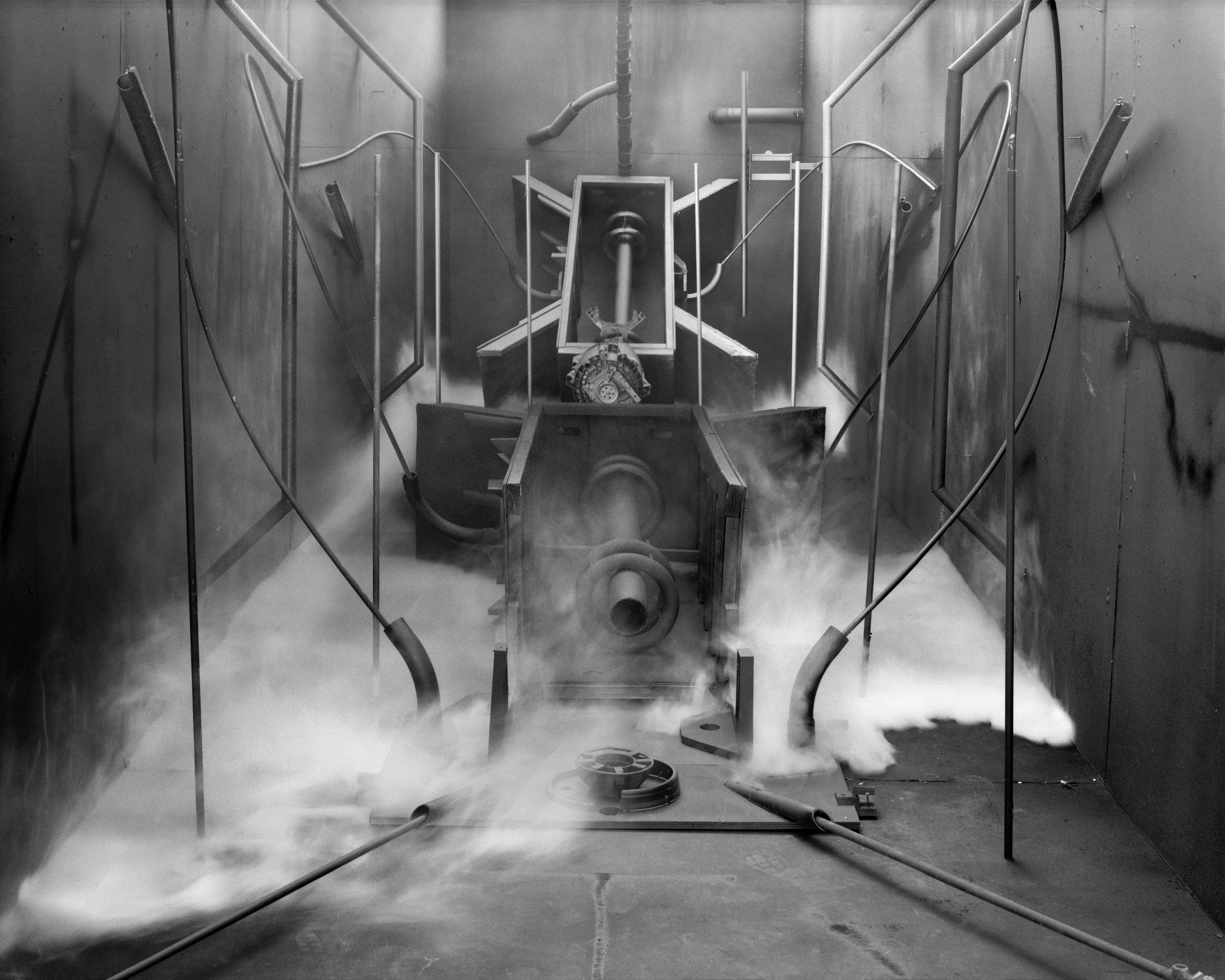 In conjunction with the exhibition in our physical gallery, Assembly presents “Afterwork” by Rodrigo Valenzuela. Based on the ghostly absence of workers in an indeterminate time and place, this work is at once futuristic and harking back to a century ago.

In staged sets suggesting abandoned factories, Valenzuela wishfully foments a revolution, enabling workers powerless in the face of relentless international movement of capital to flee or perhaps overrun their workplaces. As in a science-fiction universe where we feel a potential reality just out of reach of our present, Valenzuela’s scenes meld mechanical objects with steam or smoke, suggestive of steel manufacturing, a cloud of sweat-the only bodily proof of human toil-or a cinematic trope of futuristic atmosphere. In these eerily depopulated scenes, viewers are prompted to envision alternative possibilities to histories of workers dispossessed, or made obsolete, and industries that thrived on human pain.

Rodrigo Valenzuela is a Chilean-born, Los Angeles-based artist working in photography, video, painting, and installation. Not satisfied with the existing romanticism of blight and resurrection, Valenzuela opts for image making that is defiantly labor intensive and ambitious in scope. Detritus and industrial parts are scavenged over time, taken apart or reassembled, and transformed in the artist's own studio backdrops, then turned into flat images that confuse the viewer with scale shifts and multiple references. Using autobiographical threads to inform larger universal fields of experience, his work constructs narratives, scenes, and stories that point to the tensions found between the individual and communities. Much of his work deals with the experience of undocumented immigrants and laborers. His work has been exhibited internationally, including solo exhibitions at Lisa Kandlhofer Galerie, Vienna; the Ulrich Museum of Art, Wichita, KS; the Art Museum of the University of Memphis, TN; Klowdenmann Gallery, Los Angeles; the Frye Art Museum, Seattle; and Museo de Arte Contemporaneo, Santiago, Chile. In 2021, Valenuzlea was awarded a Guggenheim Fellowship in Photography and Smithsonian Artist Research Fellowship.