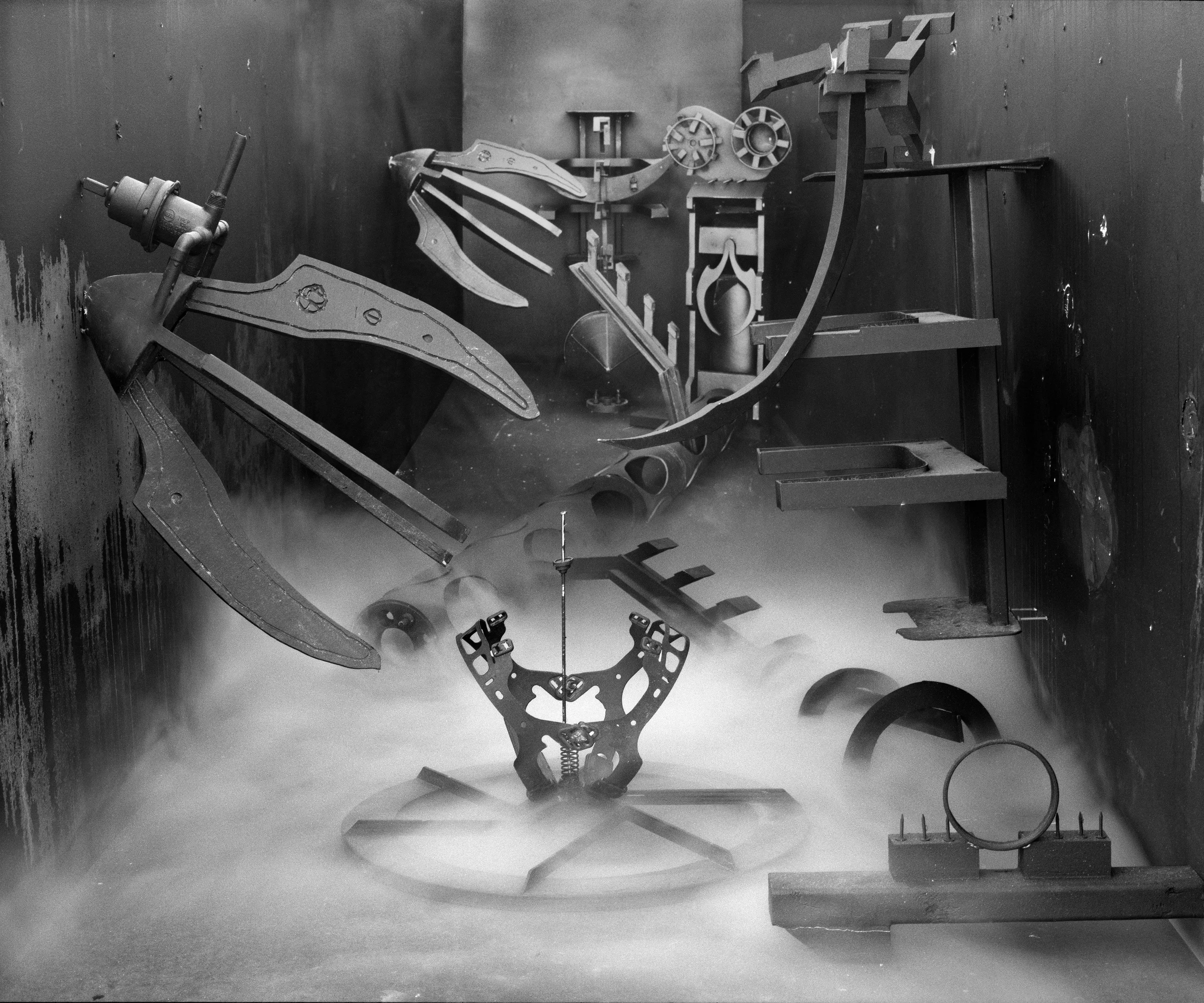In conjunction with the exhibition in our physical gallery, Assembly presents “Afterwork” by Rodrigo Valenzuela. Based on the ghostly absence of workers in an indeterminate time and place, this work is at once futuristic and harking back to a century ago.

In staged sets suggesting abandoned factories, Valenzuela wishfully foments a revolution, enabling workers powerless in the face of relentless international movement of capital to flee or perhaps overrun their workplaces. As in a science-fiction universe where we feel a potential reality just out of reach of our present, Valenzuela’s scenes meld mechanical objects with steam or smoke, suggestive of steel manufacturing, a cloud of sweat-the only bodily proof of human toil-or a cinematic trope of futuristic atmosphere. In these eerily depopulated scenes, viewers are prompted to envision alternative possibilities to histories of workers dispossessed, or made obsolete, and industries that thrived on human pain.

Rodrigo Valenzuela is a Chilean-born, Los Angeles-based artist working in photography, video, painting, and installation. Not satisfied with the existing romanticism of blight and resurrection, Valenzuela opts for image making that is defiantly labor intensive and ambitious in scope. Detritus and industrial parts are scavenged over time, taken apart or reassembled, and transformed in the artist's own studio backdrops, then turned into flat images that confuse the viewer with scale shifts and multiple references. Using autobiographical threads to inform larger universal fields of experience, his work constructs narratives, scenes, and stories that point to the tensions found between the individual and communities. Much of his work deals with the experience of undocumented immigrants and laborers. His work has been exhibited internationally, including solo exhibitions at Lisa Kandlhofer Galerie, Vienna; the Ulrich Museum of Art, Wichita, KS; the Art Museum of the University of Memphis, TN; Klowdenmann Gallery, Los Angeles; the Frye Art Museum, Seattle; and Museo de Arte Contemporaneo, Santiago, Chile. In 2021, Valenuzlea was awarded a Guggenheim Fellowship in Photography and Smithsonian Artist Research Fellowship.