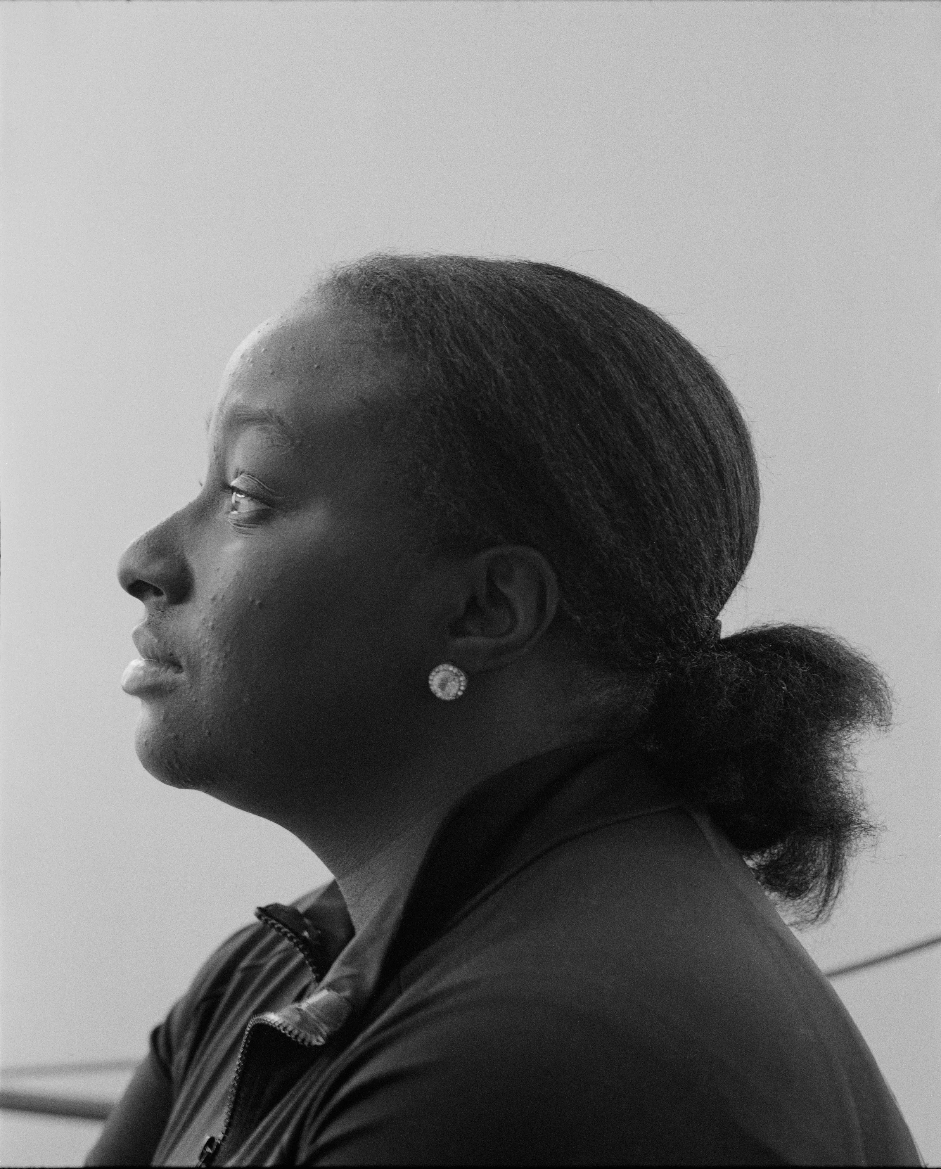 It's Expensive to be Poor #25 Lisa Profile by Hannah Price

I wanted to create a project on the costs of being poor. About how the U.S. system and bills keep the poor behind and dig a deeper hole in their life. In my research, I found a single mother of 32 years being neglected by affordable housing: Lisa McKine.

I first saw Lisa on a Philly Instagram page called nogunzone; it reposts police news and share reports from people in the community. I find it more informative than the local news, however I know several people who choose not to tune in for mental health reasons; it shows all the bad and we are currently on track to outdo last year’s homicide rate. 

Days after a tragic fire in another Philadelphia affordable housing apartment (PHA) that killed 12 people, a social media trend began with videos of people sharing themselves holding burning cigarettes near a silent smoke alarm. One in particular caught my eye, Lisa’s video of her son, telling him to wake up as a bunch of flies flew off his face.

Lisa did not grow up poor, she was raised by her dad and stepmother. Her dad worked for Philly managing janitorial duties in the courthouse. Her parents separated when she was young and it wasn’t until her 20’s when she learned bad habits from her biological mother of working the system. Lisa found herself a single mother of 2 and living in her first apartment of PHA affordable housing for ten years.

Lisa’s brother, Raul Gore (Bobby, 27) is currently on probation and has dealt with his own circumstances. He told me about the decisions he made in his early twenties that put him in and out of jail. He knows he can’t change how irresponsible he was but is now enjoying life with his family and providing for them. He works during the week and his wife on the weekends, they take turns watching their children. The environment Bobby grew up in at a younger age was surrounded by cops who watched him and his friends go to and from school. He remembers having fun with the cops by making them chase him and his friends. 

My first visit to Lisa’s place was at the beginning of March. There was an exterminator outside her building with hoses hooked up to an apartment on the second floor. Inside her apartment I noticed a particular odor and counted at least two roaches and one dead in the kitchen cabinet. Lisa had been complaining about the roach infestation to PHA since 2020, sharing records of failed exterminations and the summer of 2021 is when the flies started. The infestation has forced her to live out of bins and plastic bags. PHA exterminates the apartment every month and denies Lisa from moving to a new place. 

While photographing Lisa, I learned she has an associate in Applied Science in Construction Management from the college I work at. We crossed paths in 2018 but never met each other. Sharing personal frustrations, we spent a lot of time together as we both needed someone to just hear us and provide emotional support. Her boys Zaahir (11) and Quamir (5) are well behaved, social and sweet. Lisa provides for them all by driving Uber, bartering with her community, making and selling her own hair and skin products, as well as providing different hair services and body contouring.  

Luckily, Lisa found help to make a few months' deposit on rent for a new house outside of affordable housing. Through her 4 businesses, she plans to cover her rent of $2500. Lisa’s new house windows will help with her mood and knowing her dad is 13 minutes away in a nursing home should relieve some stress. Lisa’s dad had a stroke, causing bleeding in the brain which forced him to remove the left side of his brain. Her step mother also had brain surgery due to a horrible fall, and now both her parents are bed ridden while they recover from surgery.

Witnessing Lisa’s life, I imagined myself in her situation. A single mother unhappy in an infested home, barely getting by where the only way out is taking a huge risk renting a house not knowing she can afford it. The point of this NFT is to give back to the community, specifically Lisa so I have shared Lisa’s wallet address with you below.

The more time I spent with Lisa, the closer we became. We talked about dating and tried to provide emotional support for each other’s lives. I don’t become friends with all my subjects, but those who don’t have a problem expressing and sharing their feelings, I tend to share back. One day, I couldn’t help but break down crying and another day Lisa needed to as well. It was when we had planned to take the photograph in the window from the outside perspective that she was telling me how her dad was transferred to a different hospital. Wondering why, she demanded to see him and discovered he had a large infected bed sore that went up his back. From the photo, the scab looked at least 2’ long and 1’ wide with a fist sized faint sore. Why did they wait so long to tell Lisa? More neglect. Lisa would love to take care of him herself if she had known. In the end, Lisa still wanted to make the photograph, she wanted to keep her promise and help me with my project. I said no, but ultimately gave in even though it was completely dark out. My plan was to catch the sun setting. However, life isn’t what we plan it to be. During the photo, I could hear Lisa praying to God and her ancestors, full of sadness, hope and joy. 

To keep up with Lisa, follow her on Instagram @lovelylisa215, @hollywoodglamour.co, @mckine_building_group

Donate ether to Lisa’s address:  0x0cE11858dc7f01E6c2bEB9d1f2F6cb273484076e

Edition: 1 of 1

Commissioned by Obscura