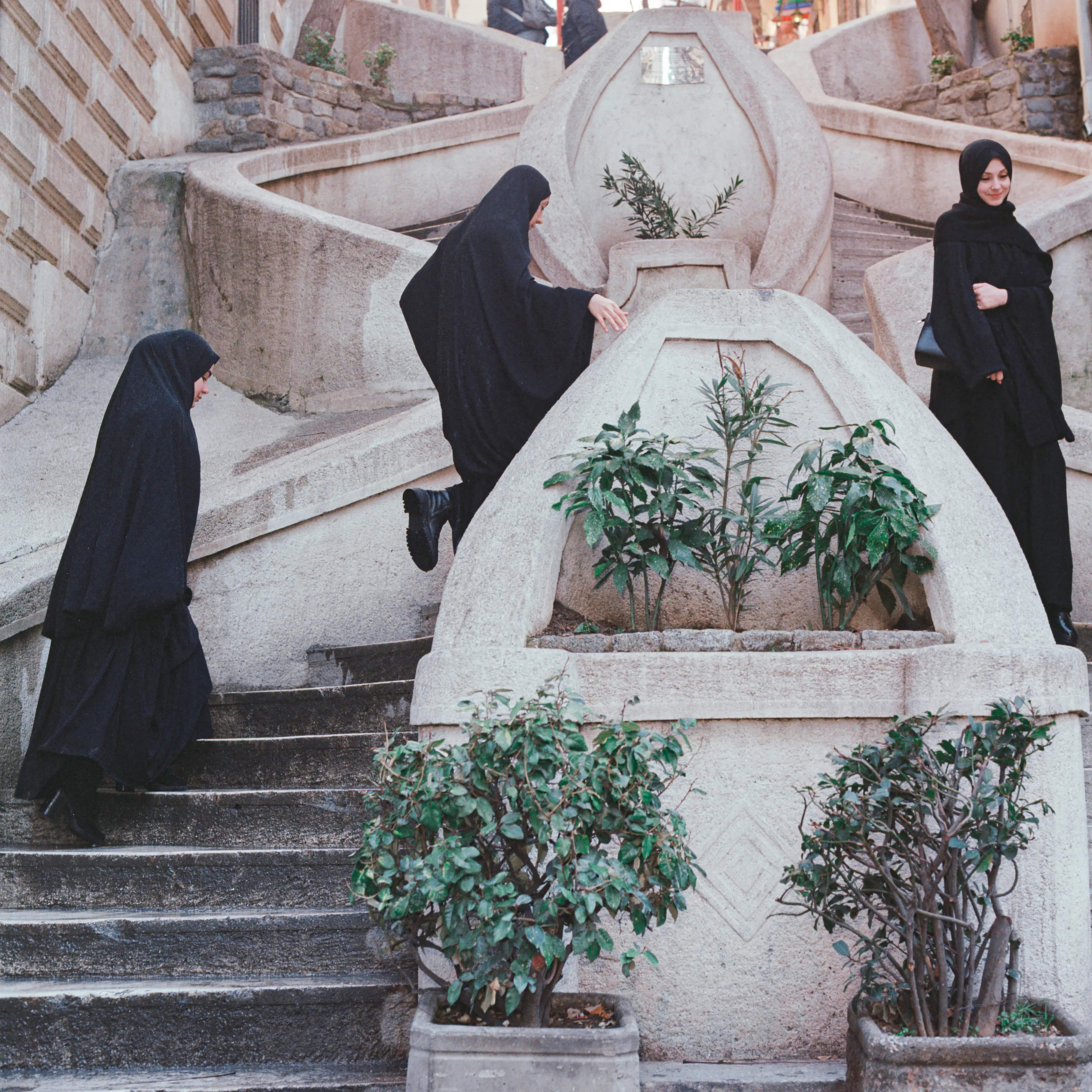 Transfiguration #24 by Sabiha Çimen

Şeyma is in Komando stairs with her friends in Istanbul, Turkey.

The impetus of this project grew out of my first book Hafız, about young girls who are memorizing Quran in schools through-out Turkey. Some marry and have children soon after graduation, but some rebel and transform themselves in a radical way; Şeyma is one of those stories of Transfiguration.

This is a world known to me because I too studied in a Quran school with my twin sister in Istanbul when I was younger.  When I returned to do my first long term photographic project l sought out familiar scenes and objects from my memory there and it was there that I met Şeyma and her unique and radical ways.

My projects usually deal with the Art of Resistance within my close circle of friends and family. In my last project the young girls' trivialities and playfulness took center stage, and now as these girls enter into adulthood they are faced with living in a world of male dominance. Sometimes, as with Şeyma, there is a need for revenge with their new found power over men and their money and habits; an inner strength coming from raw female intellect, and sexuality. 

This time my project not only focuses on the girls stories, but lies within the context of a large city- Istanbul, with its multiple layers and meanings. l am trying to provide the viewer cause and effect by viewing the different strata simultaneously and between. In the story Şeyma l am portraying her world, her fantasies, her fears, hidden love stories, songs and signs, ancient traditions, religious black-outs, and her continued spirituality that was never lost even through her Transfiguration. 


Edition: 1 of 1

Commissioned by Obscura