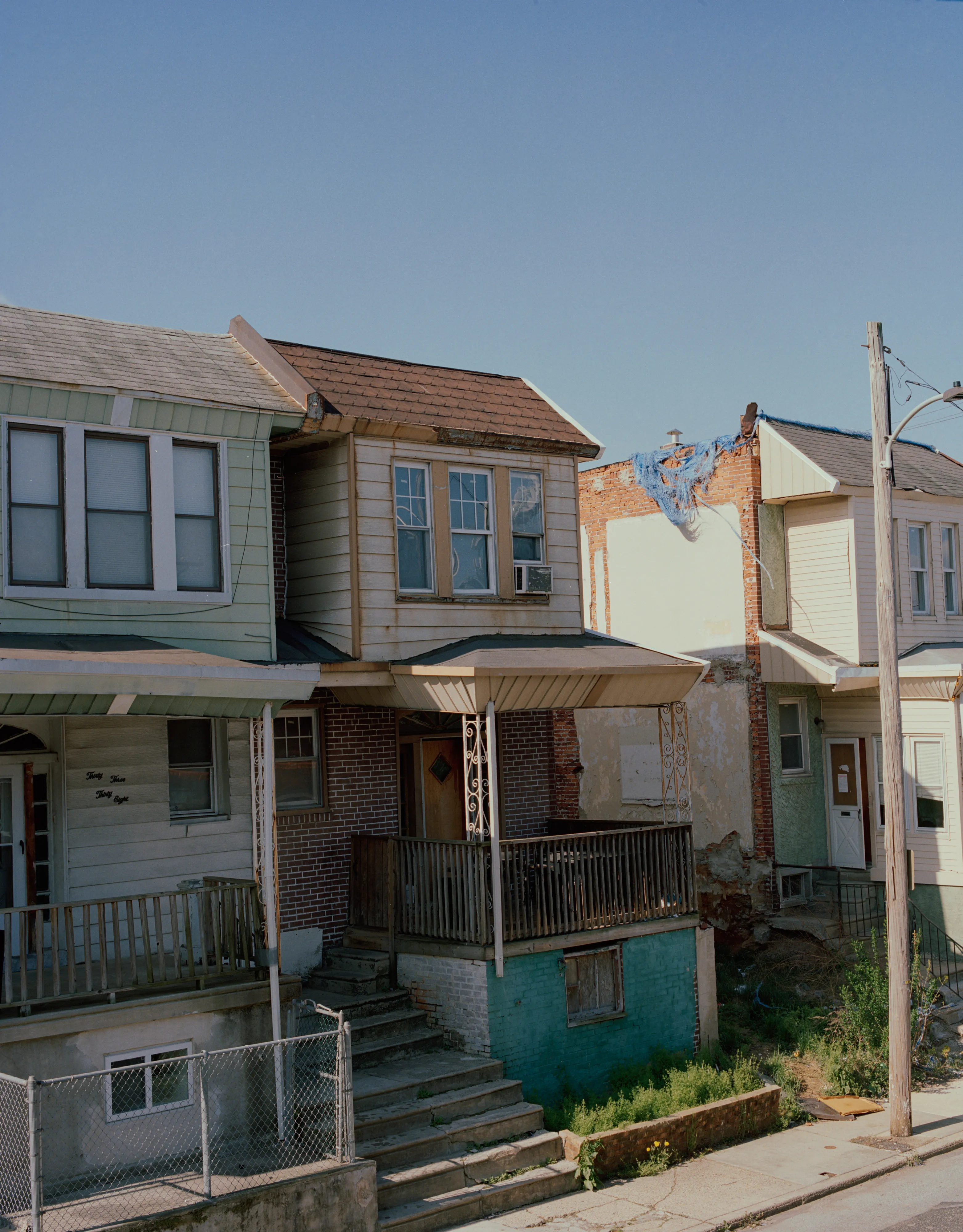 It's Expensive to be Poor #17 Random Halfway House by Hannah Price

I wanted to create a project on the costs of being poor. About how the U.S. system and bills keep the poor behind and dig a deeper hole in their life. In my research, I found a single mother of 32 years being neglected by affordable housing: Lisa McKine.

I first saw Lisa on a Philly Instagram page called nogunzone; it reposts police news and share reports from people in the community. I find it more informative than the local news, however I know several people who choose not to tune in for mental health reasons; it shows all the bad and we are currently on track to outdo last year’s homicide rate. 

Days after a tragic fire in another Philadelphia affordable housing apartment (PHA) that killed 12 people, a social media trend began with videos of people sharing themselves holding burning cigarettes near a silent smoke alarm. One in particular caught my eye, Lisa’s video of her son, telling him to wake up as a bunch of flies flew off his face.

Lisa did not grow up poor, she was raised by her dad and stepmother. Her dad worked for Philly managing janitorial duties in the courthouse. Her parents separated when she was young and it wasn’t until her 20’s when she learned bad habits from her biological mother of working the system. Lisa found herself a single mother of 2 and living in her first apartment of PHA affordable housing for ten years.

Lisa’s brother, Raul Gore (Bobby, 27) is currently on probation and has dealt with his own circumstances. He told me about the decisions he made in his early twenties that put him in and out of jail. He knows he can’t change how irresponsible he was but is now enjoying life with his family and providing for them. He works during the week and his wife on the weekends, they take turns watching their children. The environment Bobby grew up in at a younger age was surrounded by cops who watched him and his friends go to and from school. He remembers having fun with the cops by making them chase him and his friends. 

My first visit to Lisa’s place was at the beginning of March. There was an exterminator outside her building with hoses hooked up to an apartment on the second floor. Inside her apartment I noticed a particular odor and counted at least two roaches and one dead in the kitchen cabinet. Lisa had been complaining about the roach infestation to PHA since 2020, sharing records of failed exterminations and the summer of 2021 is when the flies started. The infestation has forced her to live out of bins and plastic bags. PHA exterminates the apartment every month and denies Lisa from moving to a new place. 

While photographing Lisa, I learned she has an associate in Applied Science in Construction Management from the college I work at. We crossed paths in 2018 but never met each other. Sharing personal frustrations, we spent a lot of time together as we both needed someone to just hear us and provide emotional support. Her boys Zaahir (11) and Quamir (5) are well behaved, social and sweet. Lisa provides for them all by driving Uber, bartering with her community, making and selling her own hair and skin products, as well as providing different hair services and body contouring.  

Luckily, Lisa found help to make a few months' deposit on rent for a new house outside of affordable housing. Through her 4 businesses, she plans to cover her rent of $2500. Lisa’s new house windows will help with her mood and knowing her dad is 13 minutes away in a nursing home should relieve some stress. Lisa’s dad had a stroke, causing bleeding in the brain which forced him to remove the left side of his brain. Her step mother also had brain surgery due to a horrible fall, and now both her parents are bed ridden while they recover from surgery.

Witnessing Lisa’s life, I imagined myself in her situation. A single mother unhappy in an infested home, barely getting by where the only way out is taking a huge risk renting a house not knowing she can afford it. The point of this NFT is to give back to the community, specifically Lisa so I have shared Lisa’s wallet address with you below.

The more time I spent with Lisa, the closer we became. We talked about dating and tried to provide emotional support for each other’s lives. I don’t become friends with all my subjects, but those who don’t have a problem expressing and sharing their feelings, I tend to share back. One day, I couldn’t help but break down crying and another day Lisa needed to as well. It was when we had planned to take the photograph in the window from the outside perspective that she was telling me how her dad was transferred to a different hospital. Wondering why, she demanded to see him and discovered he had a large infected bed sore that went up his back. From the photo, the scab looked at least 2’ long and 1’ wide with a fist sized faint sore. Why did they wait so long to tell Lisa? More neglect. Lisa would love to take care of him herself if she had known. In the end, Lisa still wanted to make the photograph, she wanted to keep her promise and help me with my project. I said no, but ultimately gave in even though it was completely dark out. My plan was to catch the sun setting. However, life isn’t what we plan it to be. During the photo, I could hear Lisa praying to God and her ancestors, full of sadness, hope and joy. 

To keep up with Lisa, follow her on Instagram @lovelylisa215, @hollywoodglamour.co, @mckine_building_group

Donate ether to Lisa’s address:  0x0cE11858dc7f01E6c2bEB9d1f2F6cb273484076e

Edition: 1 of 1

Commissioned by Obscura