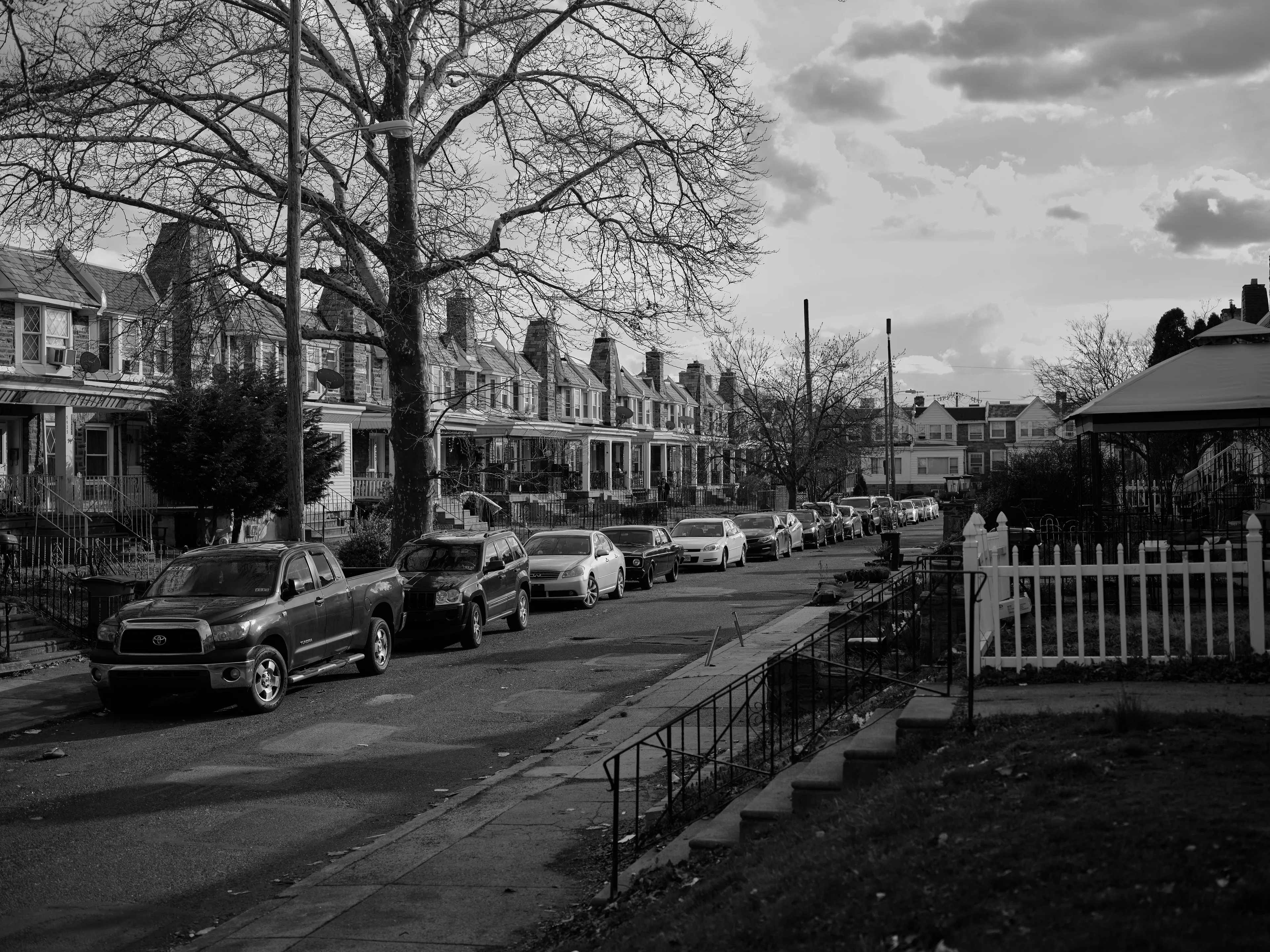 It's Expensive to be Poor #28  New Neighborhood by Hannah Price

I wanted to create a project on the costs of being poor. About how the U.S. system and bills keep the poor behind and dig a deeper hole in their life. In my research, I found a single mother of 32 years being neglected by affordable housing: Lisa McKine.

I first saw Lisa on a Philly Instagram page called nogunzone; it reposts police news and share reports from people in the community. I find it more informative than the local news, however I know several people who choose not to tune in for mental health reasons; it shows all the bad and we are currently on track to outdo last year’s homicide rate. 

Days after a tragic fire in another Philadelphia affordable housing apartment (PHA) that killed 12 people, a social media trend began with videos of people sharing themselves holding burning cigarettes near a silent smoke alarm. One in particular caught my eye, Lisa’s video of her son, telling him to wake up as a bunch of flies flew off his face.

Lisa did not grow up poor, she was raised by her dad and stepmother. Her dad worked for Philly managing janitorial duties in the courthouse. Her parents separated when she was young and it wasn’t until her 20’s when she learned bad habits from her biological mother of working the system. Lisa found herself a single mother of 2 and living in her first apartment of PHA affordable housing for ten years.

Lisa’s brother, Raul Gore (Bobby, 27) is currently on probation and has dealt with his own circumstances. He told me about the decisions he made in his early twenties that put him in and out of jail. He knows he can’t change how irresponsible he was but is now enjoying life with his family and providing for them. He works during the week and his wife on the weekends, they take turns watching their children. The environment Bobby grew up in at a younger age was surrounded by cops who watched him and his friends go to and from school. He remembers having fun with the cops by making them chase him and his friends. 

My first visit to Lisa’s place was at the beginning of March. There was an exterminator outside her building with hoses hooked up to an apartment on the second floor. Inside her apartment I noticed a particular odor and counted at least two roaches and one dead in the kitchen cabinet. Lisa had been complaining about the roach infestation to PHA since 2020, sharing records of failed exterminations and the summer of 2021 is when the flies started. The infestation has forced her to live out of bins and plastic bags. PHA exterminates the apartment every month and denies Lisa from moving to a new place. 

While photographing Lisa, I learned she has an associate in Applied Science in Construction Management from the college I work at. We crossed paths in 2018 but never met each other. Sharing personal frustrations, we spent a lot of time together as we both needed someone to just hear us and provide emotional support. Her boys Zaahir (11) and Quamir (5) are well behaved, social and sweet. Lisa provides for them all by driving Uber, bartering with her community, making and selling her own hair and skin products, as well as providing different hair services and body contouring.  

Luckily, Lisa found help to make a few months' deposit on rent for a new house outside of affordable housing. Through her 4 businesses, she plans to cover her rent of $2500. Lisa’s new house windows will help with her mood and knowing her dad is 13 minutes away in a nursing home should relieve some stress. Lisa’s dad had a stroke, causing bleeding in the brain which forced him to remove the left side of his brain. Her step mother also had brain surgery due to a horrible fall, and now both her parents are bed ridden while they recover from surgery.

Witnessing Lisa’s life, I imagined myself in her situation. A single mother unhappy in an infested home, barely getting by where the only way out is taking a huge risk renting a house not knowing she can afford it. The point of this NFT is to give back to the community, specifically Lisa so I have shared Lisa’s wallet address with you below.

The more time I spent with Lisa, the closer we became. We talked about dating and tried to provide emotional support for each other’s lives. I don’t become friends with all my subjects, but those who don’t have a problem expressing and sharing their feelings, I tend to share back. One day, I couldn’t help but break down crying and another day Lisa needed to as well. It was when we had planned to take the photograph in the window from the outside perspective that she was telling me how her dad was transferred to a different hospital. Wondering why, she demanded to see him and discovered he had a large infected bed sore that went up his back. From the photo, the scab looked at least 2’ long and 1’ wide with a fist sized faint sore. Why did they wait so long to tell Lisa? More neglect. Lisa would love to take care of him herself if she had known. In the end, Lisa still wanted to make the photograph, she wanted to keep her promise and help me with my project. I said no, but ultimately gave in even though it was completely dark out. My plan was to catch the sun setting. However, life isn’t what we plan it to be. During the photo, I could hear Lisa praying to God and her ancestors, full of sadness, hope and joy. 

To keep up with Lisa, follow her on Instagram @lovelylisa215, @hollywoodglamour.co, @mckine_building_group

Donate ether to Lisa’s address:  0x0cE11858dc7f01E6c2bEB9d1f2F6cb273484076e

Edition: 1 of 1

Commissioned by Obscura