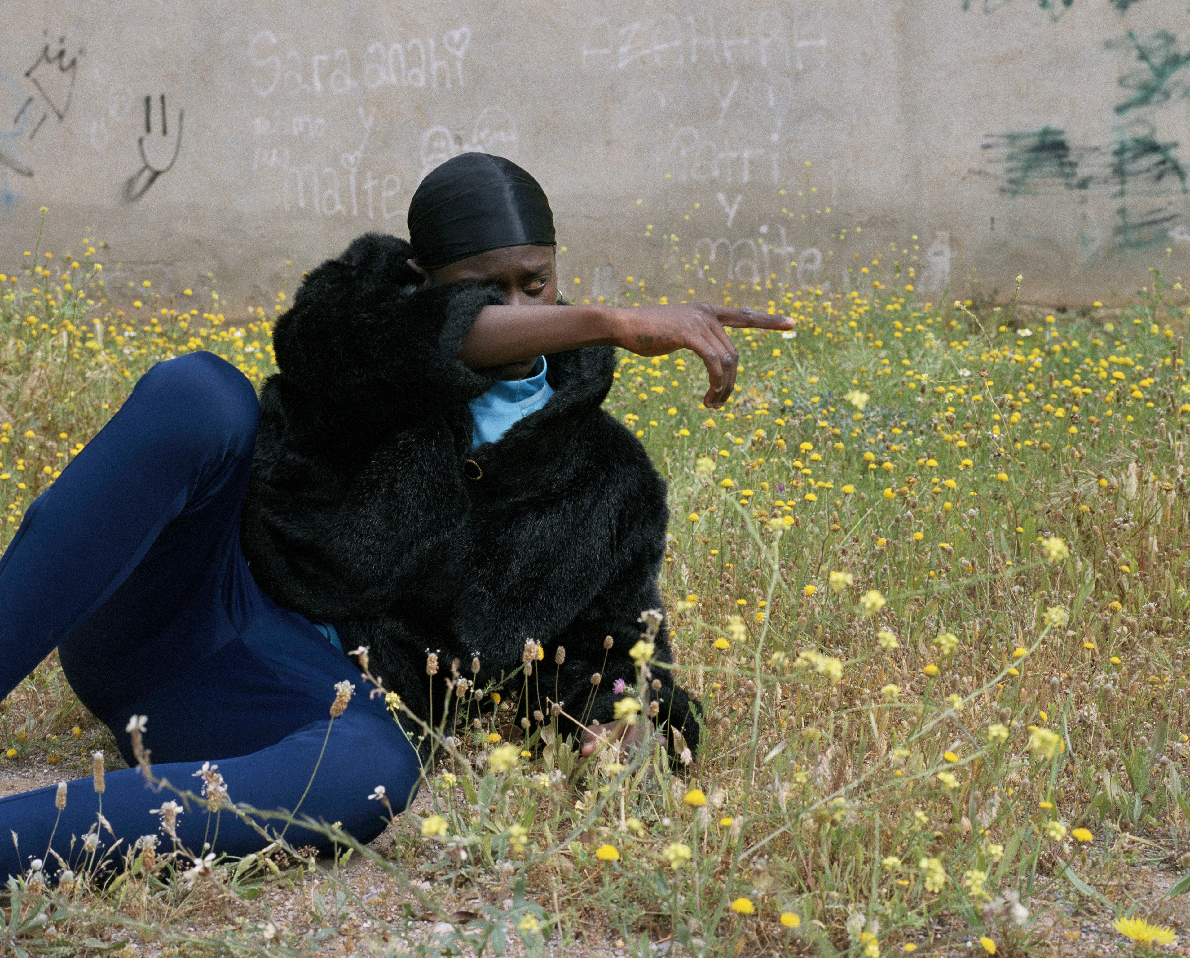 Agony In The Garden #14 by Lúa Ribeira

Guetta Flam

This series was made in various cities across the Spanish territory in collaboration with young people involved in the emerging Trap and Drill music scene.

Both genres originated in the United States as an evolution of rap music and have transcended their initial context to become globally influential movements with local scenes emerging across the world (Spain, France, Italy, Australia, Ghana, Sweden, (.))

The music is often recognized for the nihilistic lyrical content and portraying a duality between a precarious life and one of luxury and fame that becomes tangible within the global-digital-online arena. It is the hedonism versus nihilism, the darkness versus joy, the glorification of wealth and banalization of violence that resonate as a response to the values, markets and structures within contemporary society in late capitalism.

In Spain -a country with the highest youth unemployment rate in Europe- drill has become the first cultural boom that is not predominantly white. It is in cities like Madrid, Almeria or Granada where younger generations are exploring the music and the aesthetic of trap and drill and making it their own.

Often represented as apolitical, performative, or superficial, my aim with the work is to read between the lines, to reflect on the emancipatory potential of a mainstream expression of our time and how it relates to the present context of a precarious job market, institutional violence, migratory, financial and environmental crisis.

Embracing a performative collaboration that is integral to my work, I focussed on a series of gestures and landscapes to try and capture an atmosphere, hoping to transcend the idea of subculture and consider its value from a more enrooted perspective.

Edition: 1 of 1

Commissioned by Obscura