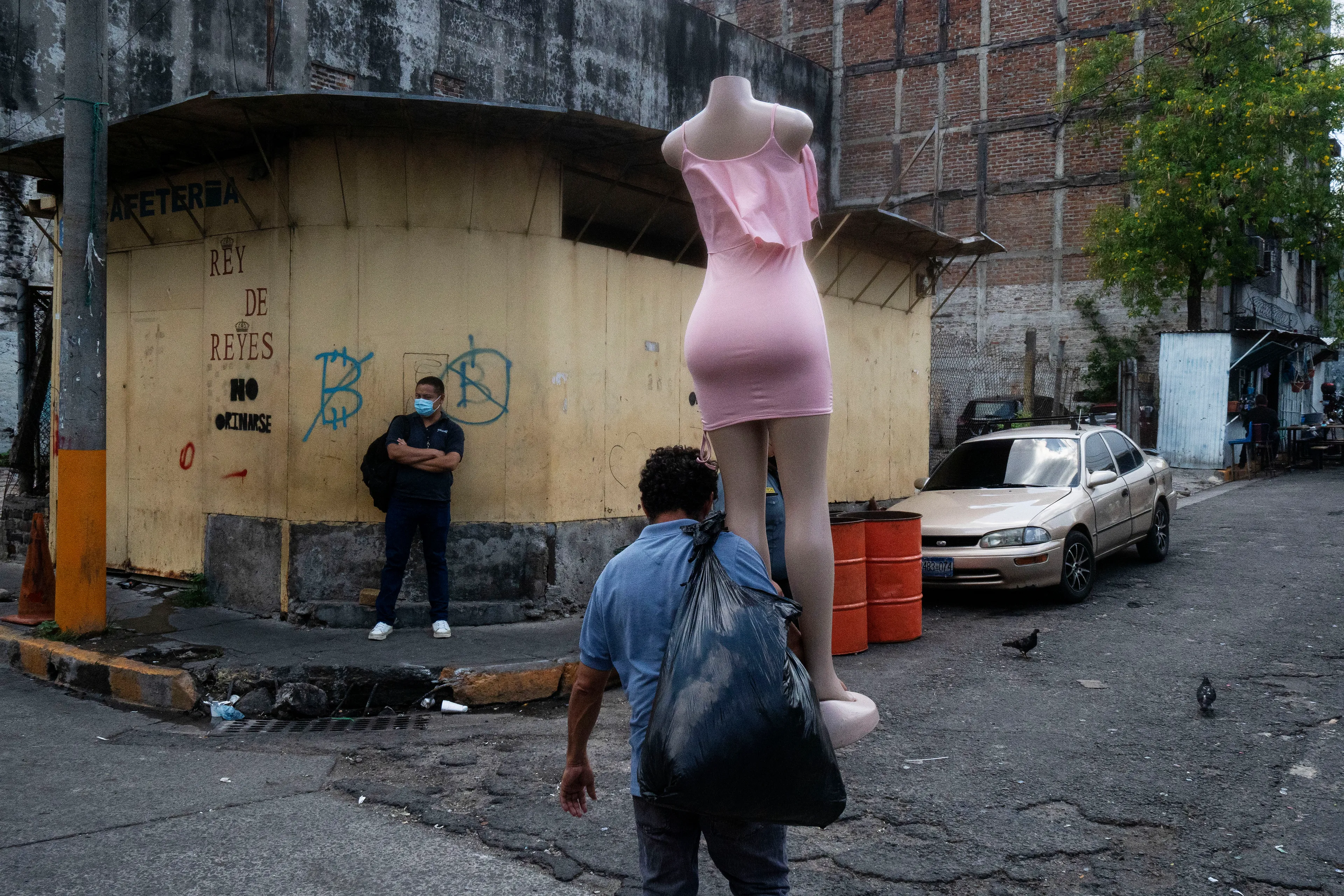 « Bitcoin Nation » #3 by Thomas Dworzak

EL SALVADOR, San Salvador, 2022/3-4. Downtown. A vendor carries a mannequin. Anti bitcoin graffiti on the wall. B.

« Bitcoin Nation » - El Salvador - Thomas Dworzak / Magnum Photos

Many photographers and journalists of my generation, interested in war and conflict, would at one point read Richard Kapusciznsky's all-time classic "The Soccer War" and watch Oliver Stone's "Salvador. » The latternow feels insanely cheesy. With the country's troubled history in mind and never having been to Central America, I found "Bitcoin Nation - El Salvador" a challenging theme to explore for this NFT project. 

I set out to straightforwardly document this alien and invisible world of bitcoin, and being 'in the realm of crypto,' I hoped it would give me access to President Nayib Bukele's surprise project. Last year he had suddenly declared Bitcoin the official currency of El Salvador - which until now was only the US dollar. The 40-year-old president of Palestinian origin started out as an anti-establishment candidate, describing himself as "the world's coolest dictator," but soon took an authoritarian turn. Yet he continues drumming the bitcoin beat, and bitcoin celebrities from all around the world keep flocking to El Salvador.
The Pacific beach town of El Zonte became "Bitcoin Beach," and "Volcano Bonds" and "Bitcoin City" are meant to be the future.

When official doors remained closed for me, I started digging for clues in the county's troubled past and present or anything, even remotely, related to the bitcoin world. Vignettes of the bloody civil war regularly popped up, and I came across a few "bitcoin events." The sudden spike of almost a hundred homicides in the course of one weekend in late March, due to what seemed a breakdown of a secret deal between the government and the two main gangs, had President Bukele declare a state of emergency, martial law and intensify the war on the gangs. I could see fringes of it. But nothing compared to the brutality of
the spectacularly filmed daily government propaganda videos of mass arrests and more-than-rough prisoner handlings I watched on TV, Twitter, and Instagram.

It was at a small bitcoin event that I found a hint why I may have been shunned and didn't get any access to show the "shiny world of Bitcoin Nation," as I had hoped. My NFT ticket was definitely the "wrong church" in the Bitcoin world. To paraphrase one of the speakers: "If I want to gamble, I go to Vegas and party with beautiful hookers, instead of being a loser, sitting around in my basement, frustrated, minting NFTs. Shitcoins."

El Salvador and the President were meant to be guests of honor at the Bitcoin 2022 conference in Miami. But due to the internal tension, he canceled the visit, and the 30+ thousand delegates had to discuss the future of bitcoin without him.

Edition: 1 of 1

Commissioned by Obscura