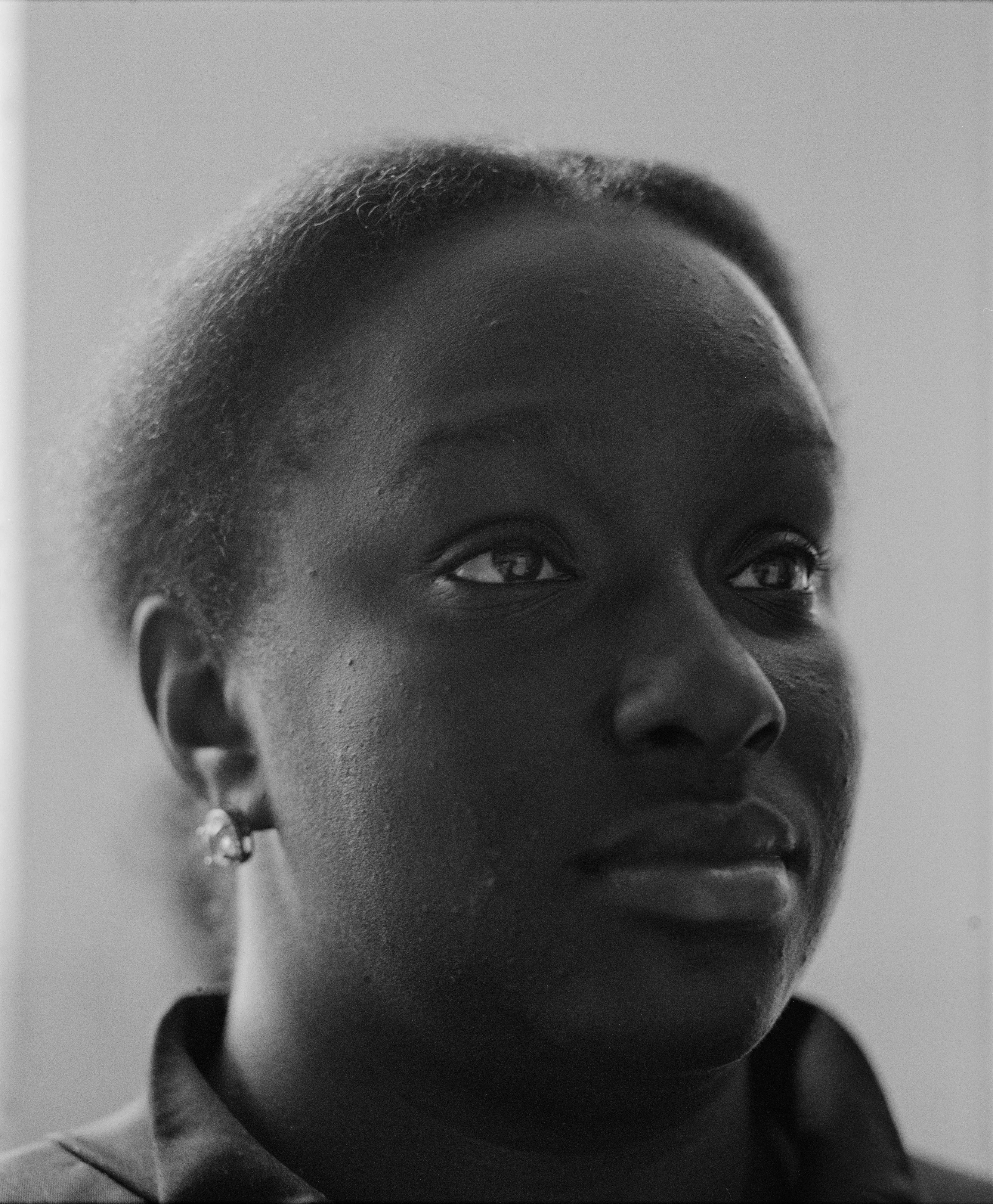 It's Expensive to be Poor #1 Lisa MicKine by Hannah Price

I wanted to create a project on the costs of being poor. About how the U.S. system and bills keep the poor behind and dig a deeper hole in their life. In my research, I found a single mother of 32 years being neglected by affordable housing: Lisa McKine.

I first saw Lisa on a Philly Instagram page called nogunzone; it reposts police news and share reports from people in the community. I find it more informative than the local news, however I know several people who choose not to tune in for mental health reasons; it shows all the bad and we are currently on track to outdo last year’s homicide rate. 

Days after a tragic fire in another Philadelphia affordable housing apartment (PHA) that killed 12 people, a social media trend began with videos of people sharing themselves holding burning cigarettes near a silent smoke alarm. One in particular caught my eye, Lisa’s video of her son, telling him to wake up as a bunch of flies flew off his face.

Lisa did not grow up poor, she was raised by her dad and stepmother. Her dad worked for Philly managing janitorial duties in the courthouse. Her parents separated when she was young and it wasn’t until her 20’s when she learned bad habits from her biological mother of working the system. Lisa found herself a single mother of 2 and living in her first apartment of PHA affordable housing for ten years.

Lisa’s brother, Raul Gore (Bobby, 27) is currently on probation and has dealt with his own circumstances. He told me about the decisions he made in his early twenties that put him in and out of jail. He knows he can’t change how irresponsible he was but is now enjoying life with his family and providing for them. He works during the week and his wife on the weekends, they take turns watching their children. The environment Bobby grew up in at a younger age was surrounded by cops who watched him and his friends go to and from school. He remembers having fun with the cops by making them chase him and his friends. 

My first visit to Lisa’s place was at the beginning of March. There was an exterminator outside her building with hoses hooked up to an apartment on the second floor. Inside her apartment I noticed a particular odor and counted at least two roaches and one dead in the kitchen cabinet. Lisa had been complaining about the roach infestation to PHA since 2020, sharing records of failed exterminations and the summer of 2021 is when the flies started. The infestation has forced her to live out of bins and plastic bags. PHA exterminates the apartment every month and denies Lisa from moving to a new place. 

While photographing Lisa, I learned she has an associate in Applied Science in Construction Management from the college I work at. We crossed paths in 2018 but never met each other. Sharing personal frustrations, we spent a lot of time together as we both needed someone to just hear us and provide emotional support. Her boys Zaahir (11) and Quamir (5) are well behaved, social and sweet. Lisa provides for them all by driving Uber, bartering with her community, making and selling her own hair and skin products, as well as providing different hair services and body contouring.  

Luckily, Lisa found help to make a few months' deposit on rent for a new house outside of affordable housing. Through her 4 businesses, she plans to cover her rent of $2500. Lisa’s new house windows will help with her mood and knowing her dad is 13 minutes away in a nursing home should relieve some stress. Lisa’s dad had a stroke, causing bleeding in the brain which forced him to remove the left side of his brain. Her step mother also had brain surgery due to a horrible fall, and now both her parents are bed ridden while they recover from surgery.

Witnessing Lisa’s life, I imagined myself in her situation. A single mother unhappy in an infested home, barely getting by where the only way out is taking a huge risk renting a house not knowing she can afford it. The point of this NFT is to give back to the community, specifically Lisa so I have shared Lisa’s wallet address with you below.

The more time I spent with Lisa, the closer we became. We talked about dating and tried to provide emotional support for each other’s lives. I don’t become friends with all my subjects, but those who don’t have a problem expressing and sharing their feelings, I tend to share back. One day, I couldn’t help but break down crying and another day Lisa needed to as well. It was when we had planned to take the photograph in the window from the outside perspective that she was telling me how her dad was transferred to a different hospital. Wondering why, she demanded to see him and discovered he had a large infected bed sore that went up his back. From the photo, the scab looked at least 2’ long and 1’ wide with a fist sized faint sore. Why did they wait so long to tell Lisa? More neglect. Lisa would love to take care of him herself if she had known. In the end, Lisa still wanted to make the photograph, she wanted to keep her promise and help me with my project. I said no, but ultimately gave in even though it was completely dark out. My plan was to catch the sun setting. However, life isn’t what we plan it to be. During the photo, I could hear Lisa praying to God and her ancestors, full of sadness, hope and joy. 

To keep up with Lisa, follow her on Instagram @lovelylisa215, @hollywoodglamour.co, @mckine_building_group

Donate ether to Lisa’s address:  0x0cE11858dc7f01E6c2bEB9d1f2F6cb273484076e

Edition: 1 of 1

Commissioned by Obscura