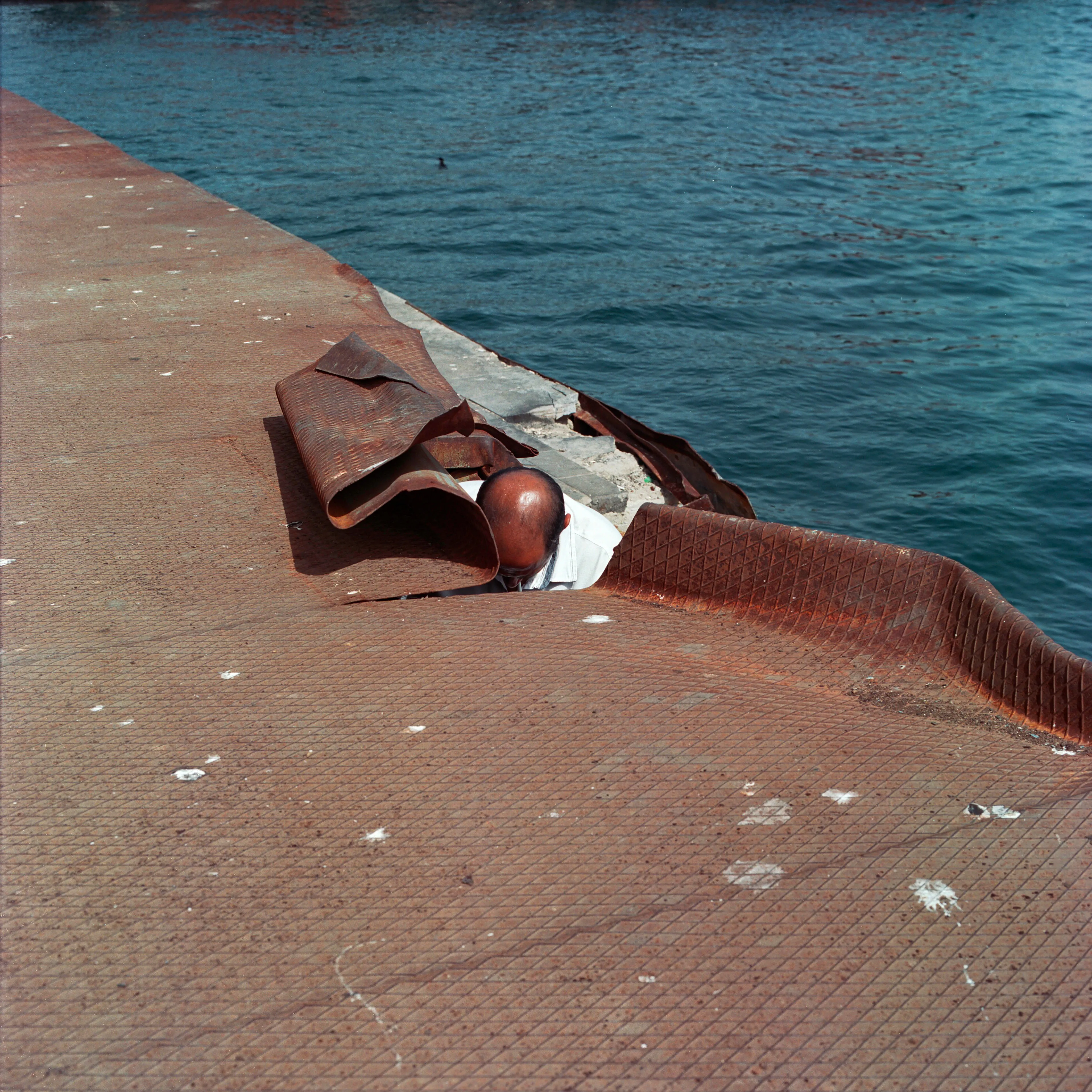 Transfiguration #23 by Sabiha Çimen

A man lighting his cigarettes against the wind in Istanbul, Turkey.

The impetus of this project grew out of my first book Hafız, about young girls who are memorizing Quran in schools through-out Turkey. Some marry and have children soon after graduation, but some rebel and transform themselves in a radical way; Şeyma is one of those stories of Transfiguration.

This is a world known to me because I too studied in a Quran school with my twin sister in Istanbul when I was younger.  When I returned to do my first long term photographic project l sought out familiar scenes and objects from my memory there and it was there that I met Şeyma and her unique and radical ways.

My projects usually deal with the Art of Resistance within my close circle of friends and family. In my last project the young girls' trivialities and playfulness took center stage, and now as these girls enter into adulthood they are faced with living in a world of male dominance. Sometimes, as with Şeyma, there is a need for revenge with their new found power over men and their money and habits; an inner strength coming from raw female intellect, and sexuality. 

This time my project not only focuses on the girls stories, but lies within the context of a large city- Istanbul, with its multiple layers and meanings. l am trying to provide the viewer cause and effect by viewing the different strata simultaneously and between. In the story Şeyma l am portraying her world, her fantasies, her fears, hidden love stories, songs and signs, ancient traditions, religious black-outs, and her continued spirituality that was never lost even through her Transfiguration. 


Edition: 1 of 1

Commissioned by Obscura