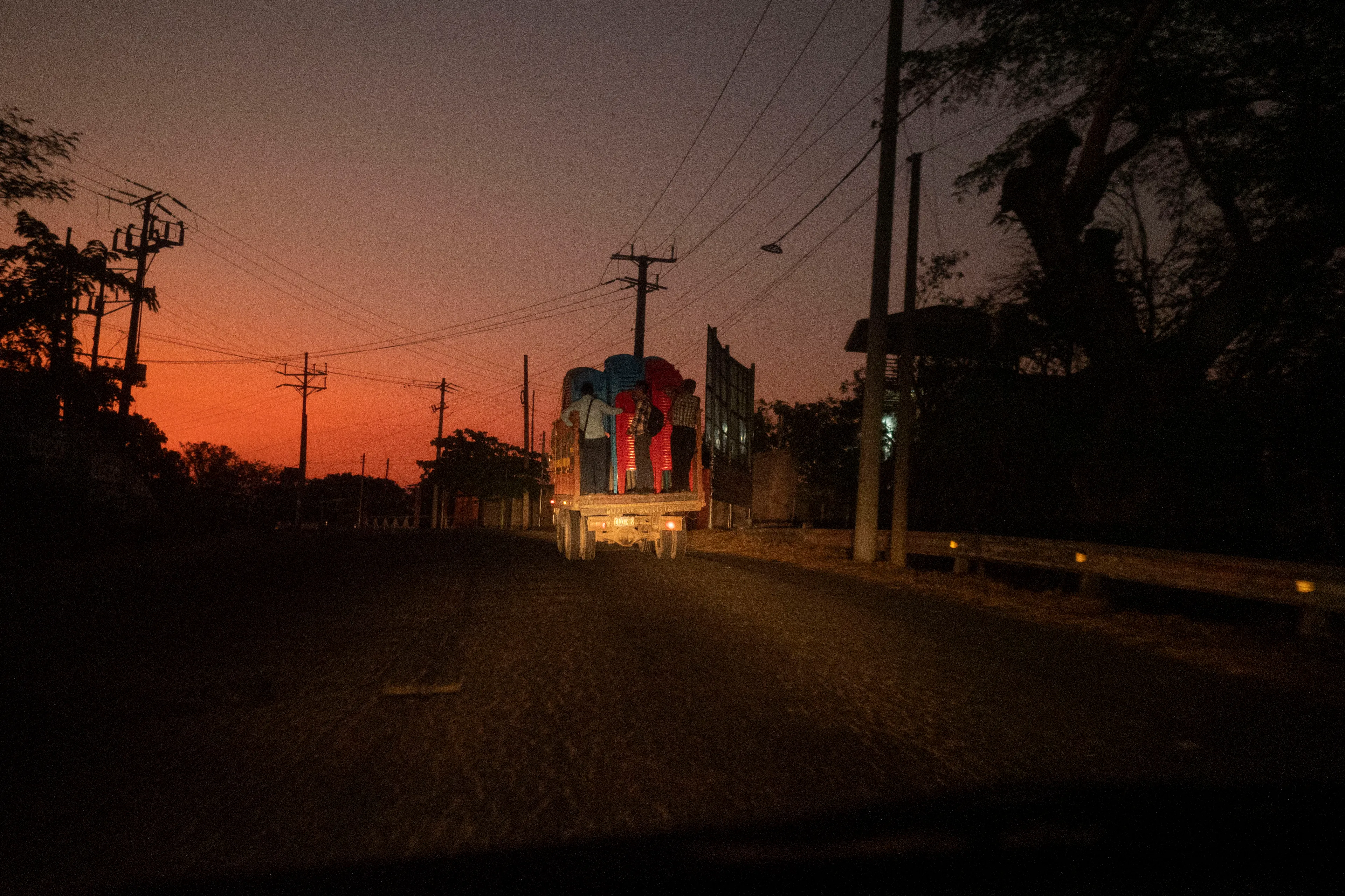 « Bitcoin Nation » #30 by Thomas Dworzak

EL SALVADOR, Berlin, 2022/3-4. Near volcanoes. Men transporting plastic chairs.

« Bitcoin Nation » - El Salvador - Thomas Dworzak / Magnum Photos

Many photographers and journalists of my generation, interested in war and conflict, would at one point read Richard Kapusciznsky's all-time classic "The Soccer War" and watch Oliver Stone's "Salvador. » The latternow feels insanely cheesy. With the country's troubled history in mind and never having been to Central America, I found "Bitcoin Nation - El Salvador" a challenging theme to explore for this NFT project. 

I set out to straightforwardly document this alien and invisible world of bitcoin, and being 'in the realm of crypto,' I hoped it would give me access to President Nayib Bukele's surprise project. Last year he had suddenly declared Bitcoin the official currency of El Salvador - which until now was only the US dollar. The 40-year-old president of Palestinian origin started out as an anti-establishment candidate, describing himself as "the world's coolest dictator," but soon took an authoritarian turn. Yet he continues drumming the bitcoin beat, and bitcoin celebrities from all around the world keep flocking to El Salvador.
The Pacific beach town of El Zonte became "Bitcoin Beach," and "Volcano Bonds" and "Bitcoin City" are meant to be the future.

When official doors remained closed for me, I started digging for clues in the county's troubled past and present or anything, even remotely, related to the bitcoin world. Vignettes of the bloody civil war regularly popped up, and I came across a few "bitcoin events." The sudden spike of almost a hundred homicides in the course of one weekend in late March, due to what seemed a breakdown of a secret deal between the government and the two main gangs, had President Bukele declare a state of emergency, martial law and intensify the war on the gangs. I could see fringes of it. But nothing compared to the brutality of
the spectacularly filmed daily government propaganda videos of mass arrests and more-than-rough prisoner handlings I watched on TV, Twitter, and Instagram.

It was at a small bitcoin event that I found a hint why I may have been shunned and didn't get any access to show the "shiny world of Bitcoin Nation," as I had hoped. My NFT ticket was definitely the "wrong church" in the Bitcoin world. To paraphrase one of the speakers: "If I want to gamble, I go to Vegas and party with beautiful hookers, instead of being a loser, sitting around in my basement, frustrated, minting NFTs. Shitcoins."

El Salvador and the President were meant to be guests of honor at the Bitcoin 2022 conference in Miami. But due to the internal tension, he canceled the visit, and the 30+ thousand delegates had to discuss the future of bitcoin without him.

Edition: 1 of 1

Commissioned by Obscura