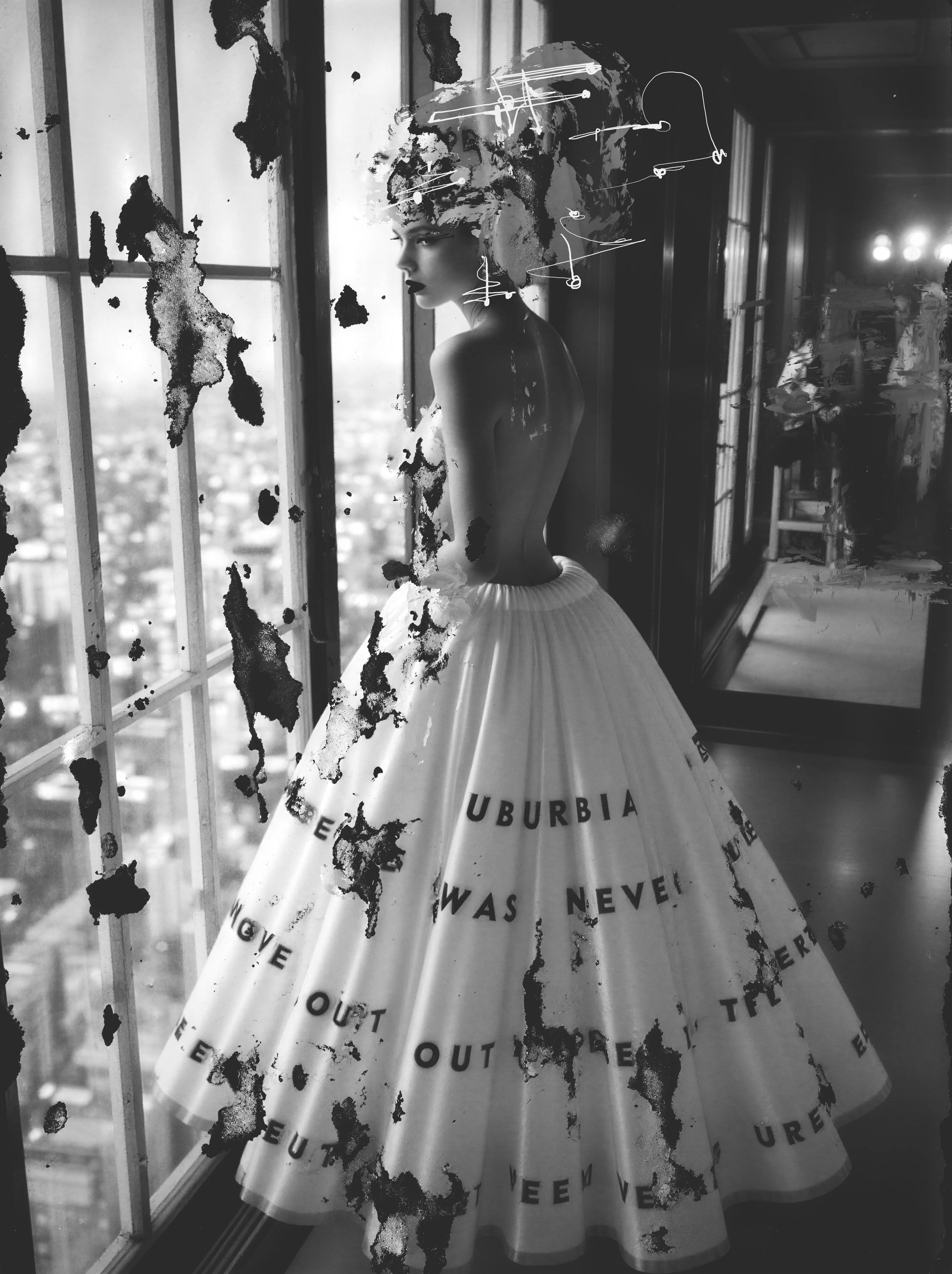 She waits at the penthouse window like she’s listening to the city breathe, the skirt around her thick with quiet prophecy. Ink frets at the fabric, already hinting at the moment it will shift—fracture—becoming a storm of drones tearing themselves free of the hem. She stands calm in the eye of it, as if she has always known the weather would answer to her. She was always Suburbia Undone.
