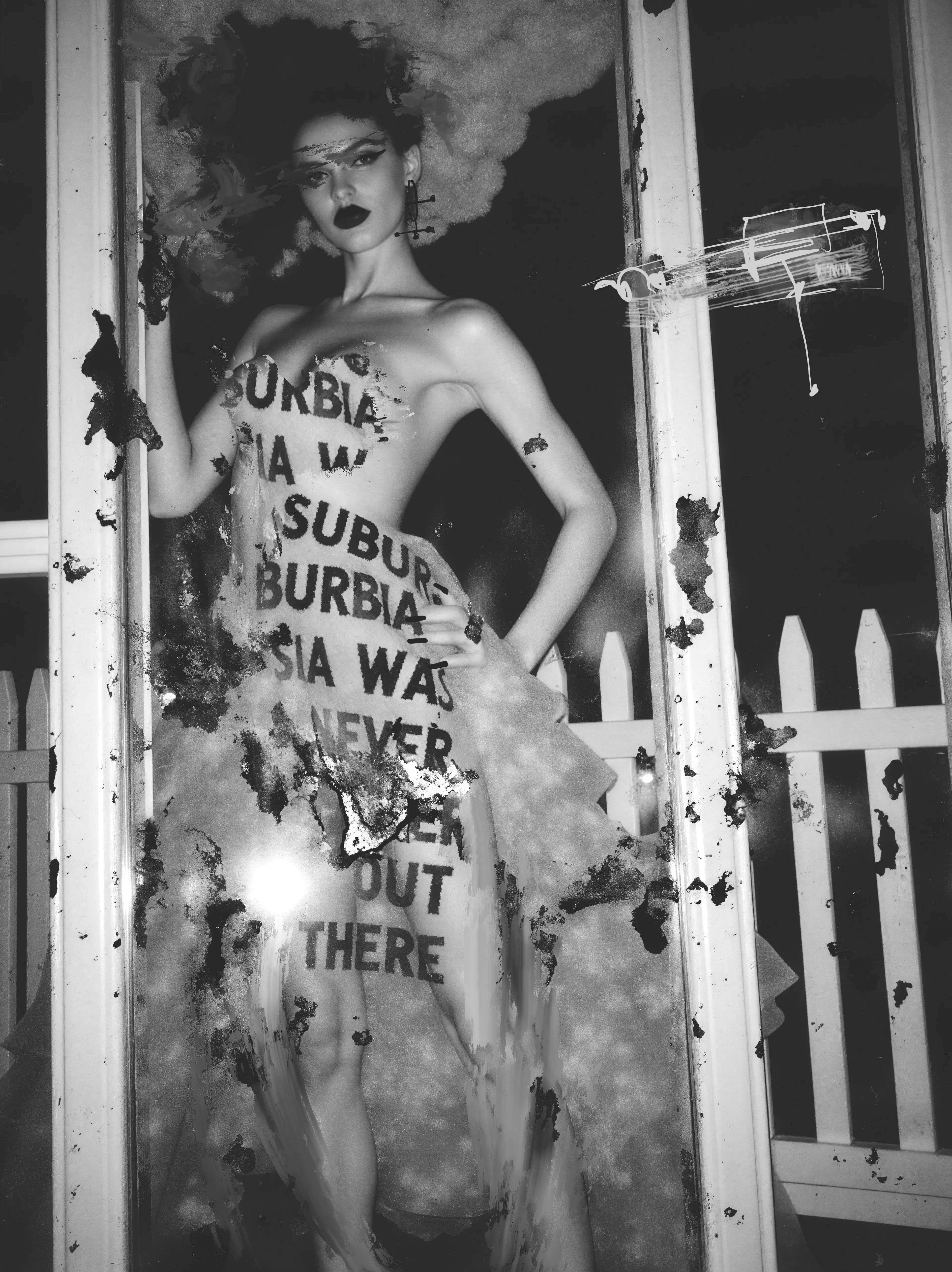 She stands at the edge of a picket-fence dream, the words melting down her body like a prophecy that was ignored. Ink burns through the tulle, turning her into a quiet storm—half apparition, half revolution—waiting for Suburbia to realise that she had rejected it. 