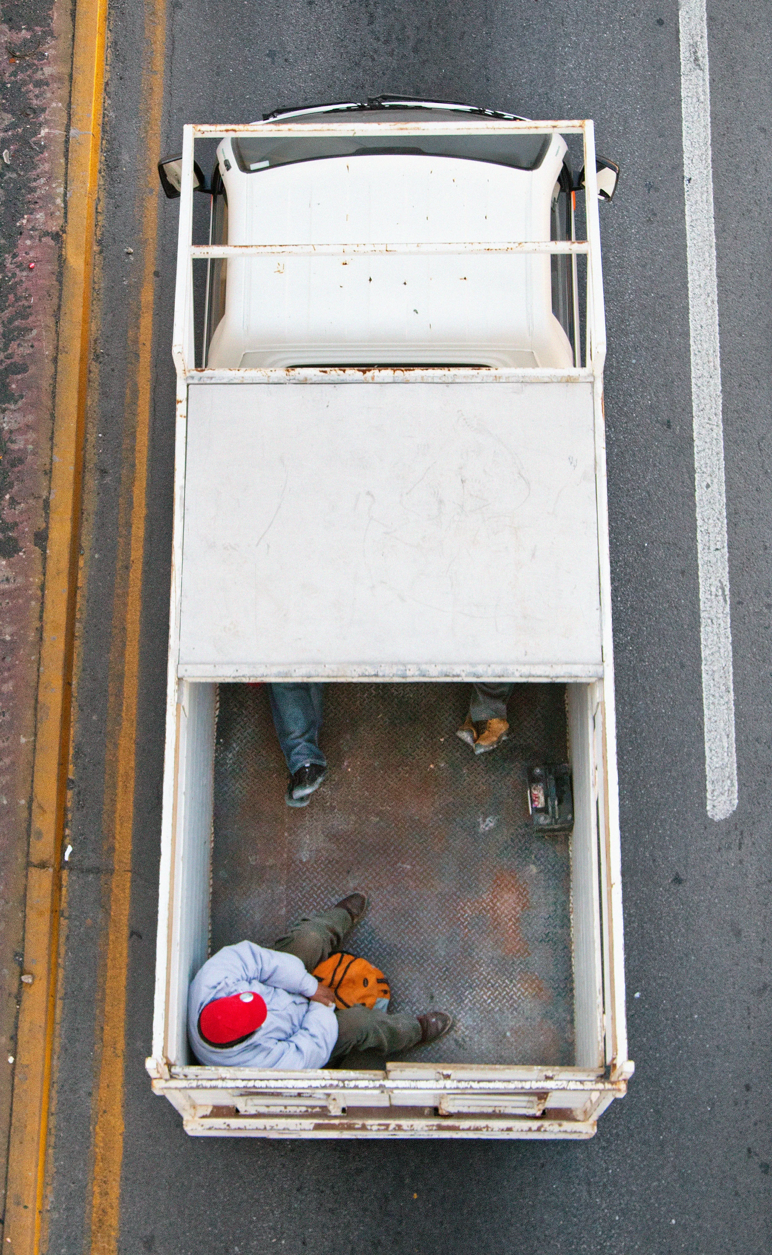 This photograph is part of my series, Carpoolers, which depicts laborers in México captured from an overpass, commuting between distant suburbs and urban centers. Like much of my work, this project comes from a desire to tell the story of the dramatic environmental, economic, and demographic changes playing out in my home city of Monterrey. This series has circulated the internet since 2011 and has been exhibited widely around the world.