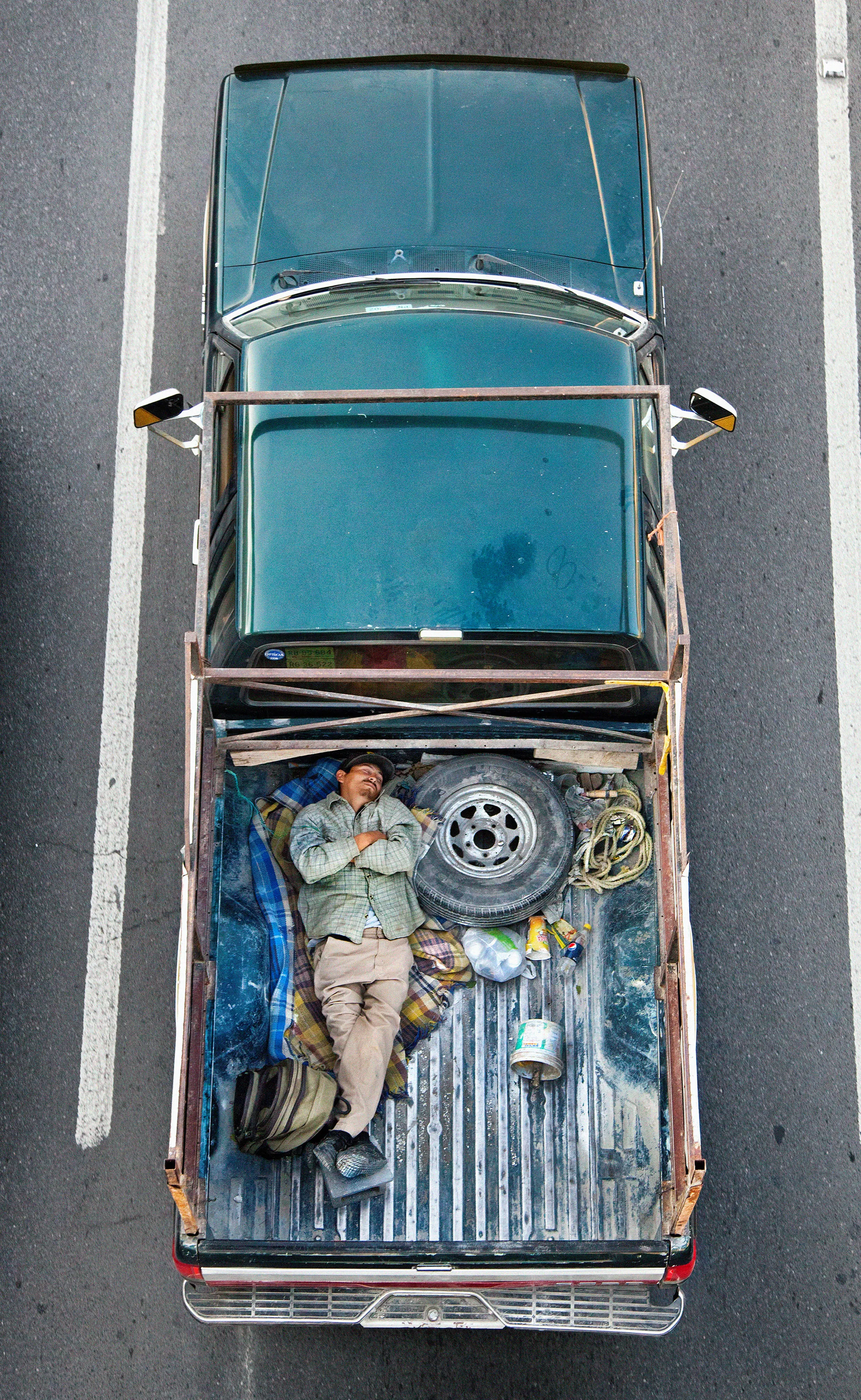 This photograph is part of my series, Carpoolers, which depicts laborers in México captured from an overpass, commuting between distant suburbs and urban centers. Like much of my work, this project comes from a desire to tell the story of the dramatic environmental, economic, and demographic changes playing out in my home city of Monterrey. This series has circulated the internet since 2011 and has been exhibited widely around the world.