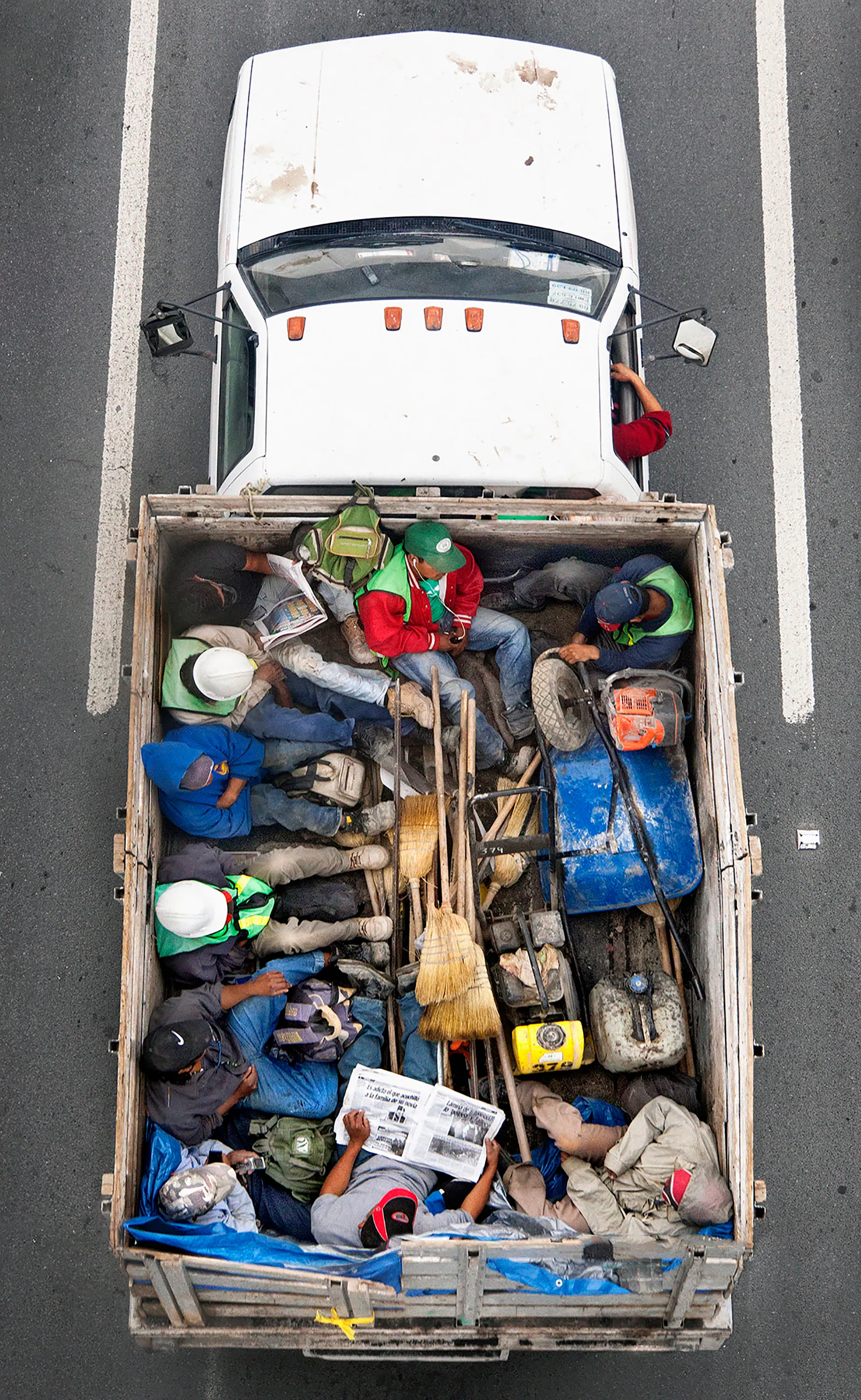 This photograph is part of my series, Carpoolers, which depicts laborers in México captured from an overpass, commuting between distant suburbs and urban centers. Like much of my work, this project comes from a desire to tell the story of the dramatic environmental, economic, and demographic changes playing out in my home city of Monterrey. This series has circulated the internet since 2011 and has been exhibited widely around the world.