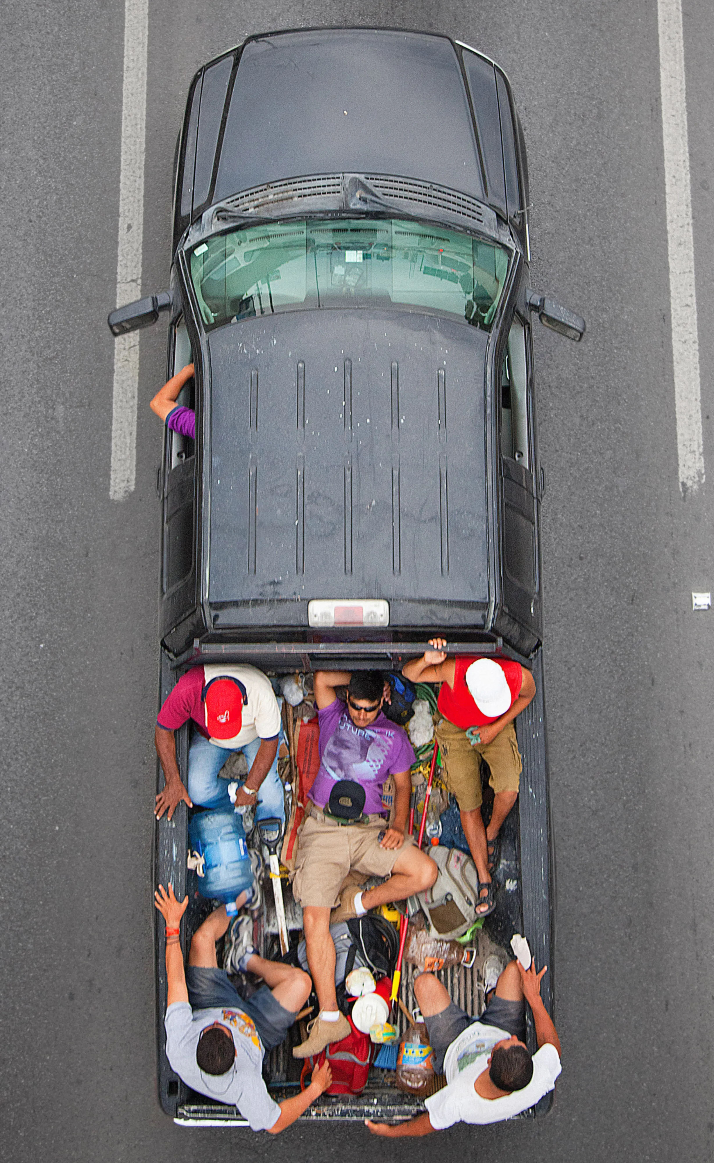 This photograph is part of my series, Carpoolers, which depicts laborers in México captured from an overpass, commuting between distant suburbs and urban centers. Like much of my work, this project comes from a desire to tell the story of the dramatic environmental, economic, and demographic changes playing out in my home city of Monterrey. This series has circulated the internet since 2011 and has been exhibited widely around the world.