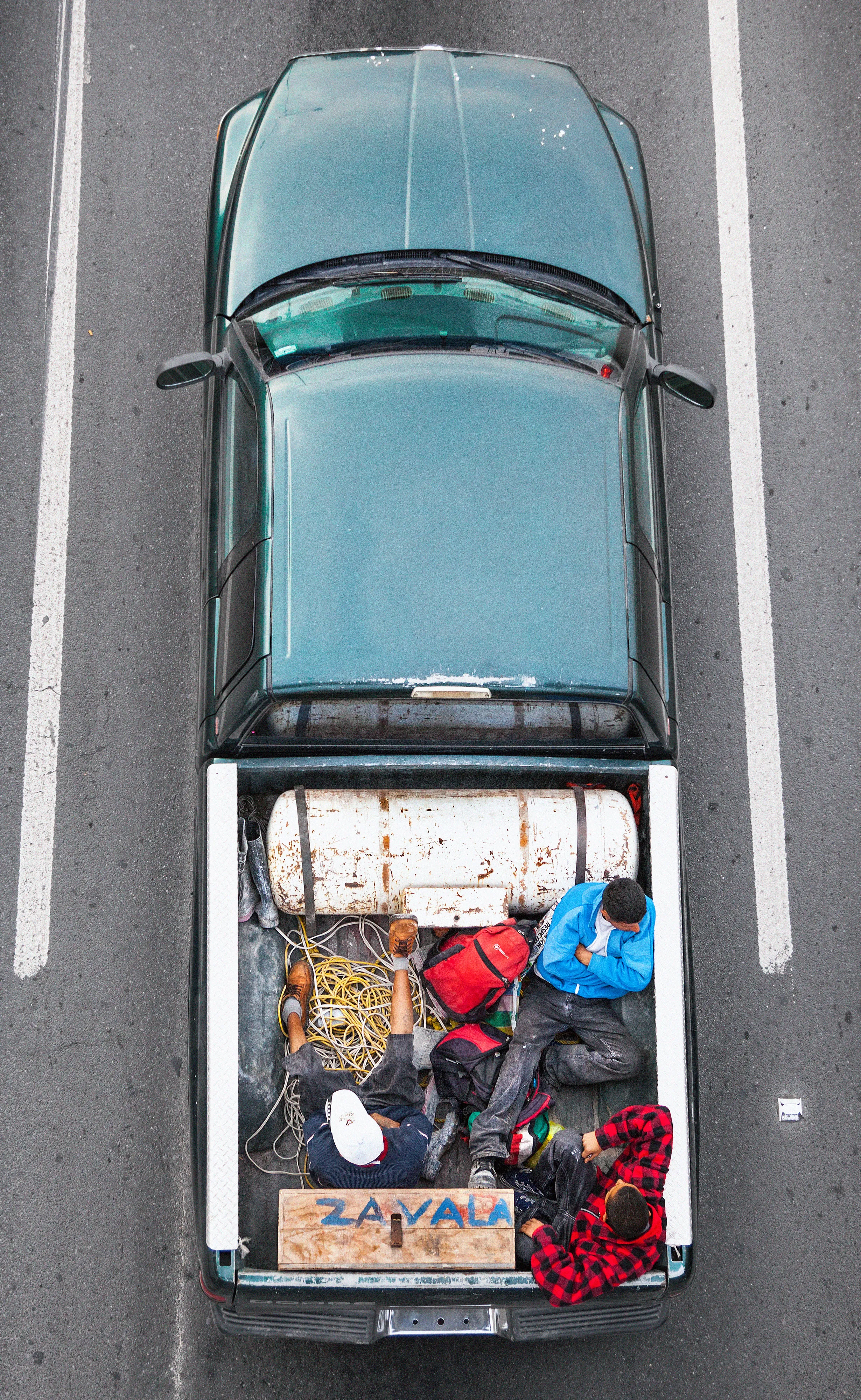 This photograph is part of my series, Carpoolers, which depicts laborers in México captured from an overpass, commuting between distant suburbs and urban centers. Like much of my work, this project comes from a desire to tell the story of the dramatic environmental, economic, and demographic changes playing out in my home city of Monterrey. This series has circulated the internet since 2011 and has been exhibited widely around the world.