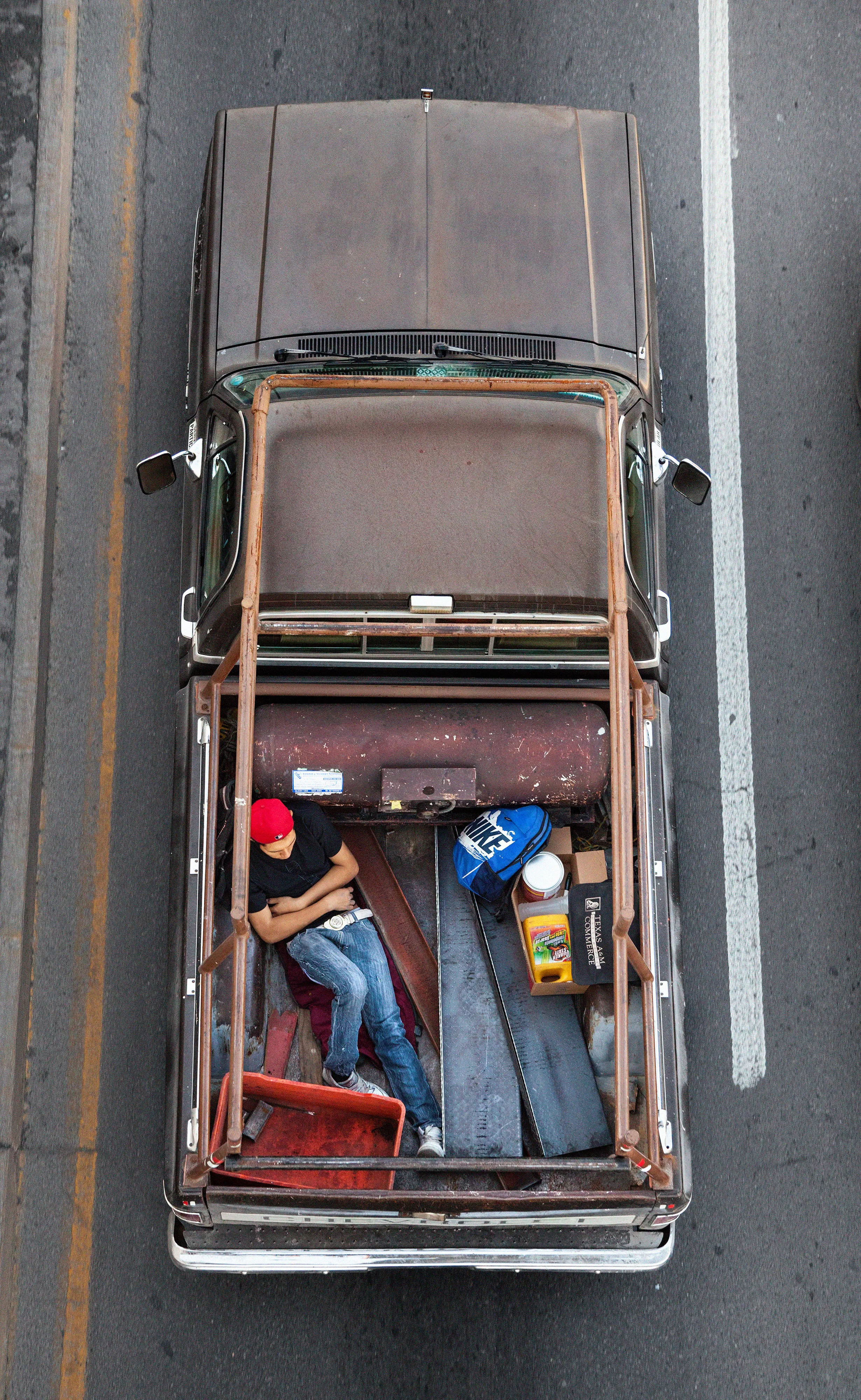 This photograph is part of my series, Carpoolers, which depicts laborers in México captured from an overpass, commuting between distant suburbs and urban centers. Like much of my work, this project comes from a desire to tell the story of the dramatic environmental, economic, and demographic changes playing out in my home city of Monterrey. This series has circulated the internet since 2011 and has been exhibited widely around the world.