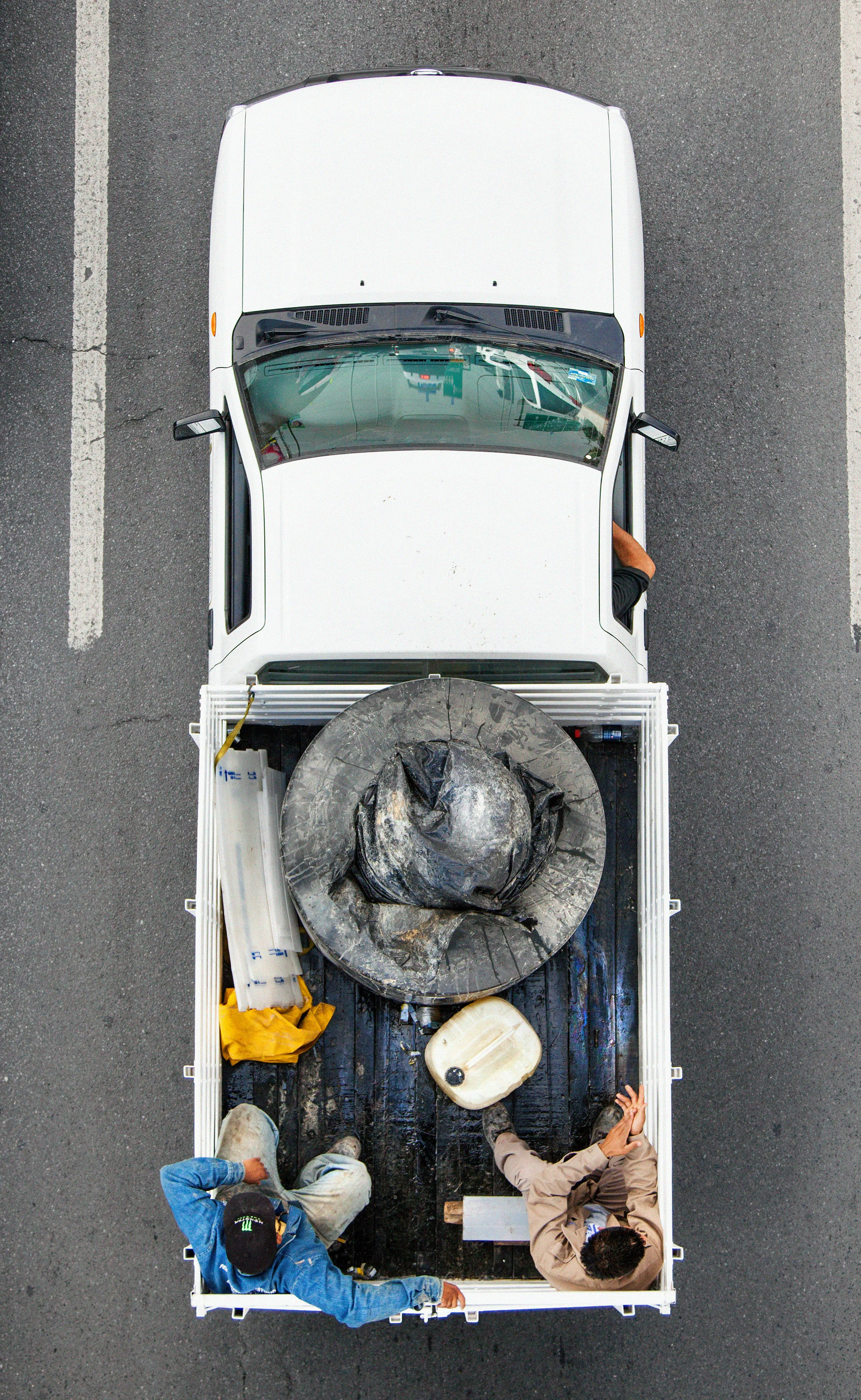 This photograph is part of my series, Carpoolers, which depicts laborers in México captured from an overpass, commuting between distant suburbs and urban centers. Like much of my work, this project comes from a desire to tell the story of the dramatic environmental, economic, and demographic changes playing out in my home city of Monterrey. This series has circulated the internet since 2011 and has been exhibited widely around the world.