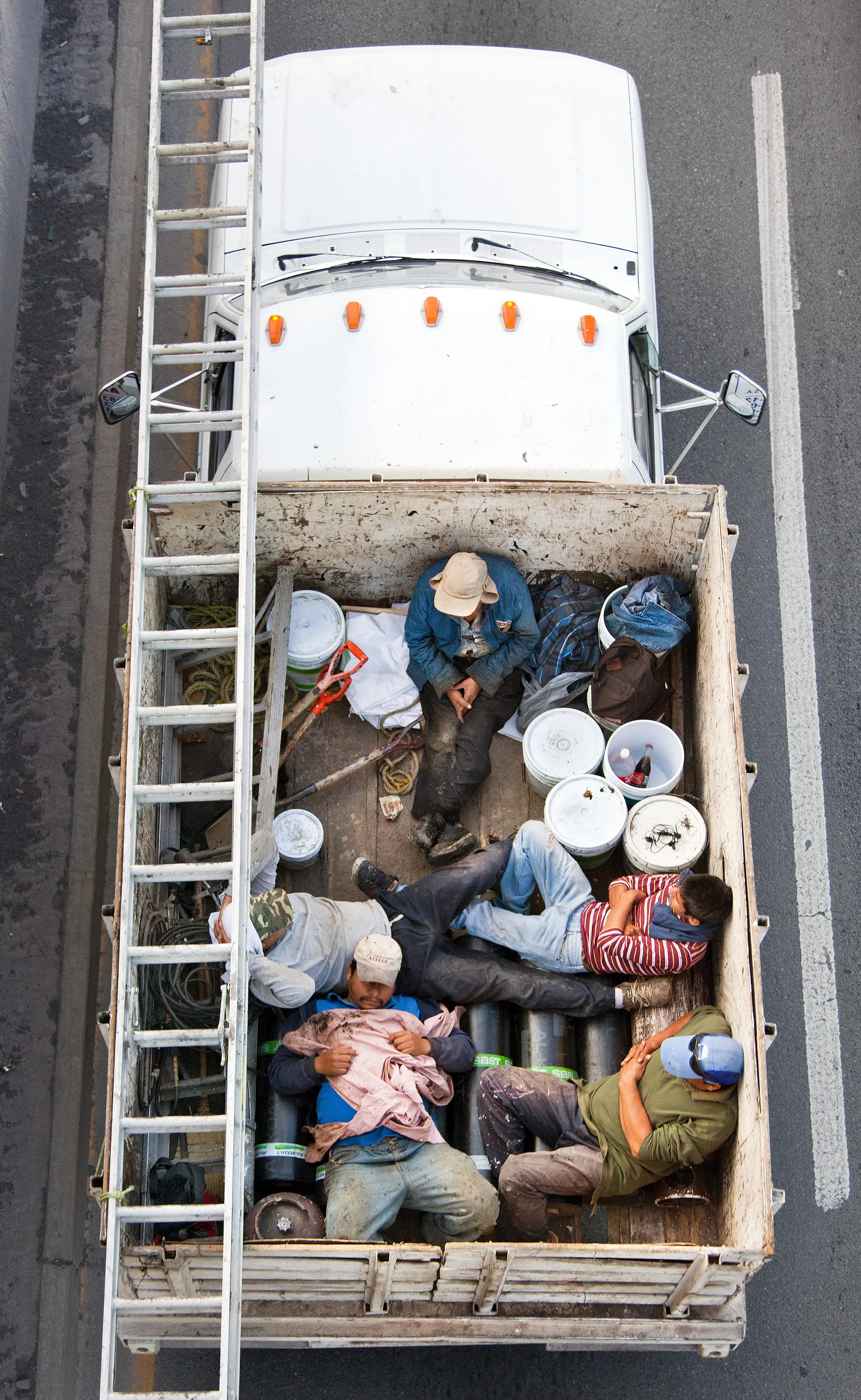 This photograph is part of my series, Carpoolers, which depicts laborers in México captured from an overpass, commuting between distant suburbs and urban centers. Like much of my work, this project comes from a desire to tell the story of the dramatic environmental, economic, and demographic changes playing out in my home city of Monterrey. This series has circulated the internet since 2011 and has been exhibited widely around the world.