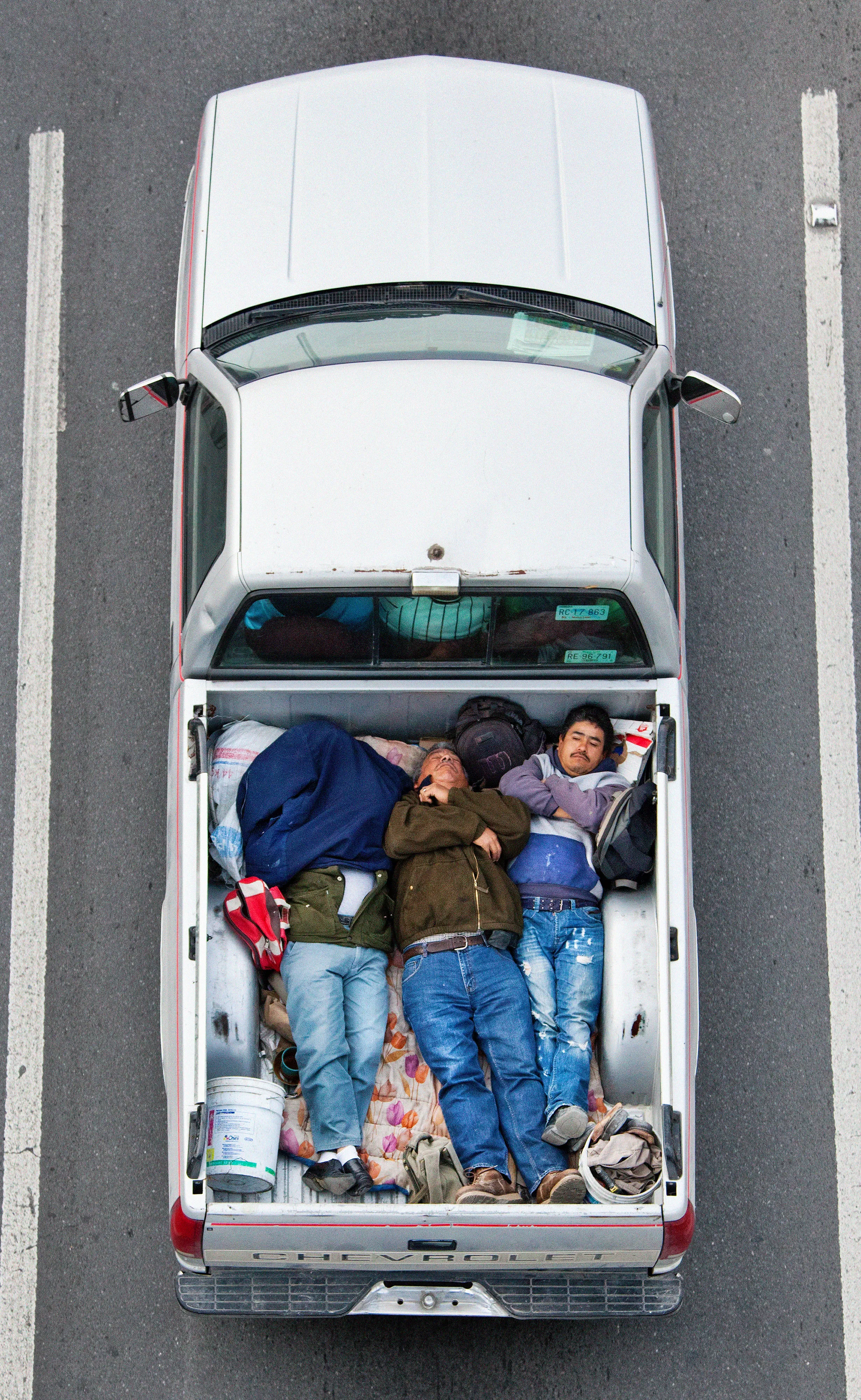 This photograph is part of my series, Carpoolers, which depicts laborers in México captured from an overpass, commuting between distant suburbs and urban centers. Like much of my work, this project comes from a desire to tell the story of the dramatic environmental, economic, and demographic changes playing out in my home city of Monterrey. This series has circulated the internet since 2011 and has been exhibited widely around the world.