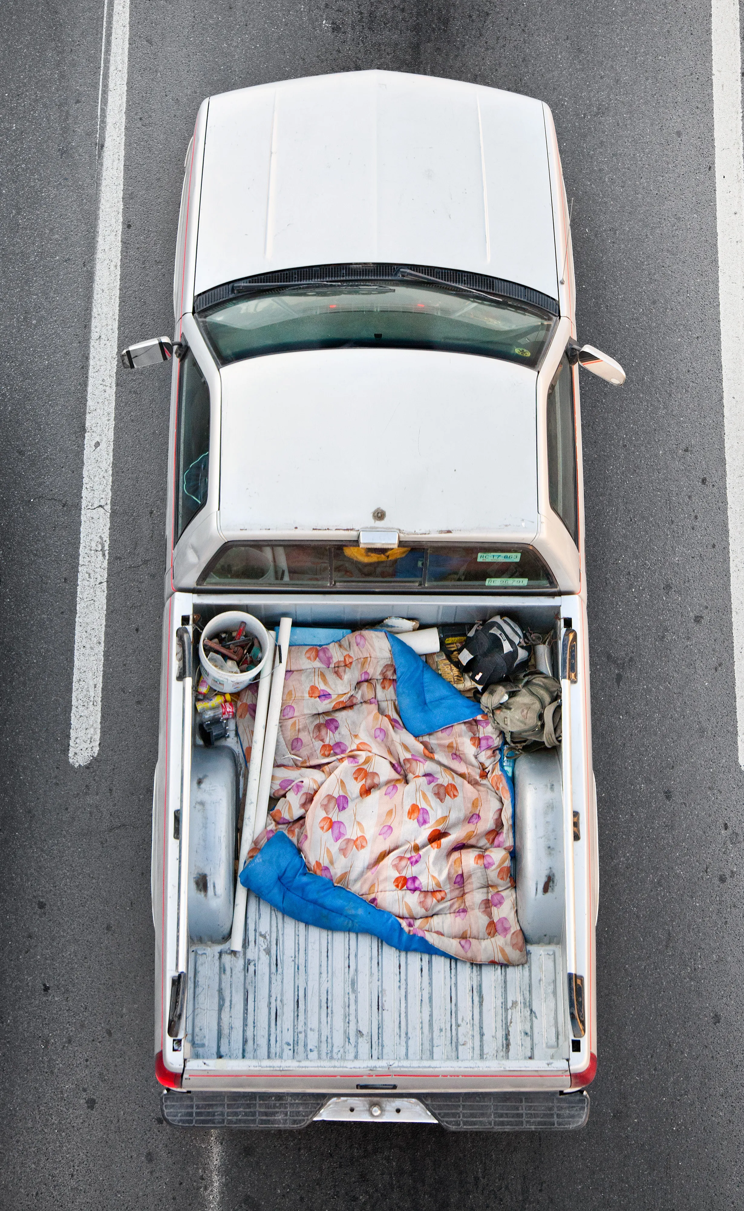 This photograph is part of my series, Carpoolers, which depicts laborers in México captured from an overpass, commuting between distant suburbs and urban centers. Like much of my work, this project comes from a desire to tell the story of the dramatic environmental, economic, and demographic changes playing out in my home city of Monterrey. This series has circulated the internet since 2011 and has been exhibited widely around the world.