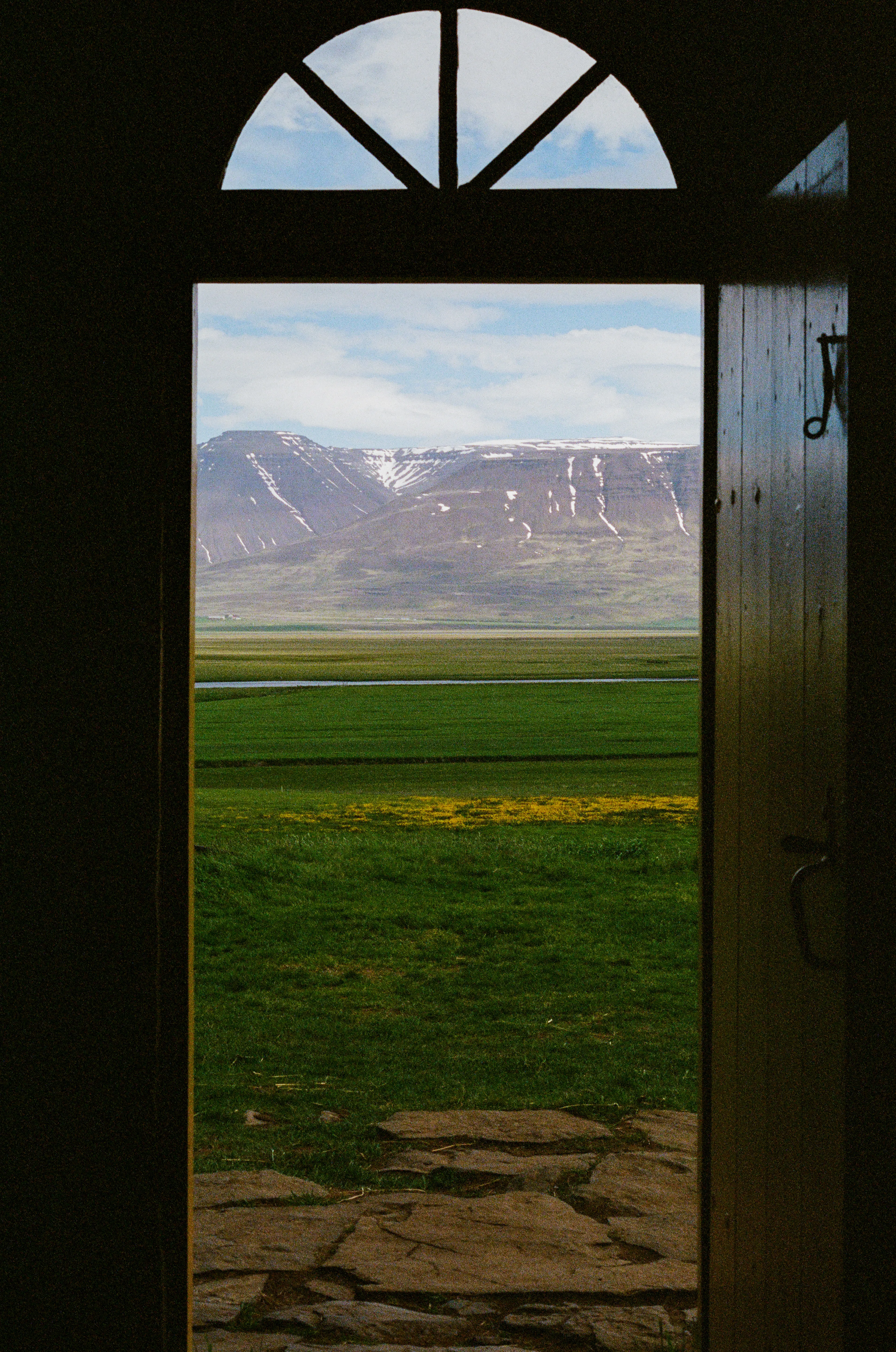 Walking down the long hallway of an old turf hut, a glimpse of the incredible, panoramic landscape is framed in the doorway.