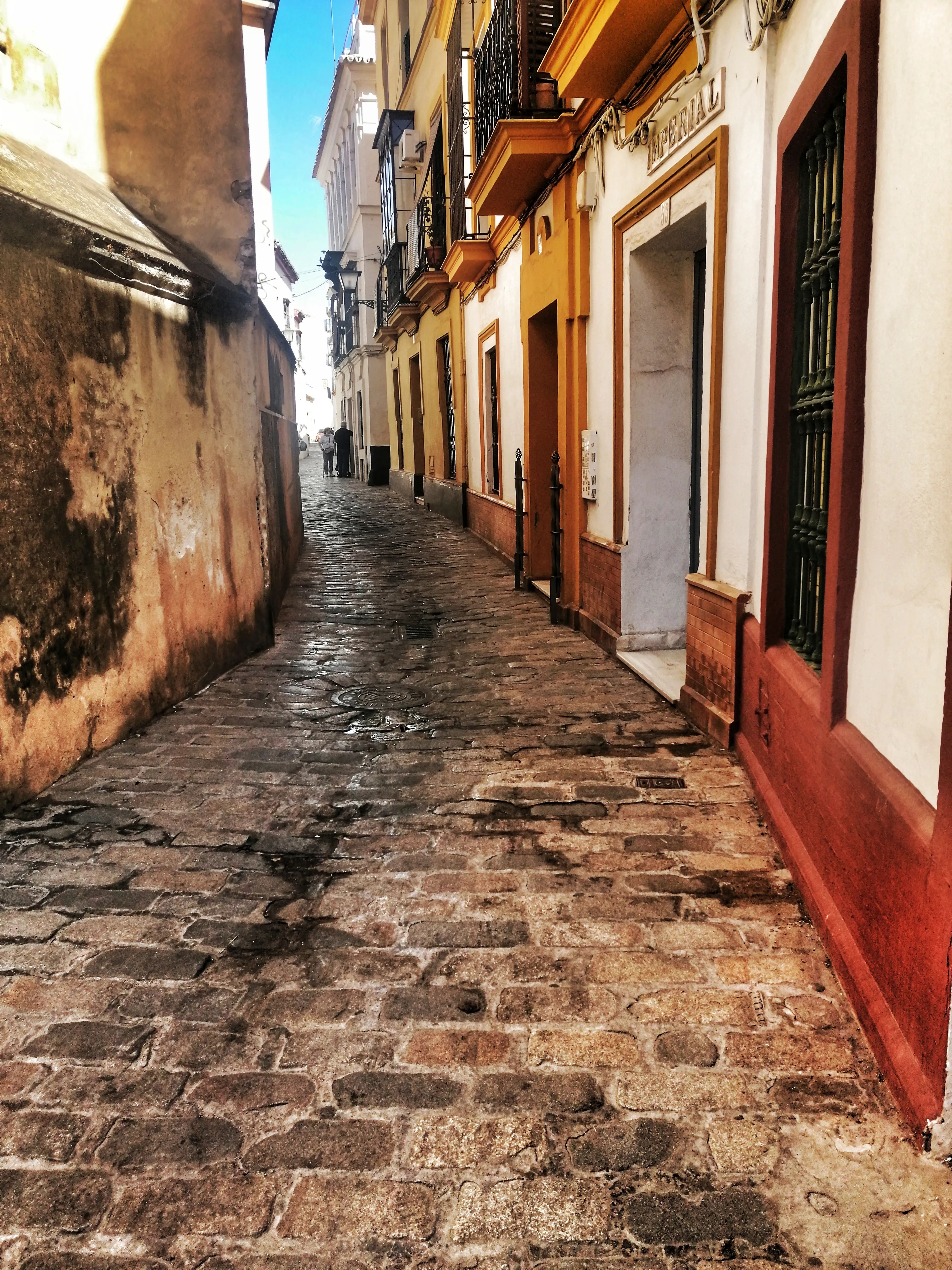 Second edition of the photograph **La Antigua (Original Edition) # 2/6** with a degree of desaturation (around 25%) with respect to the original image. **Colors of Seville** Collection. 6 photographs taken on the streets of Seville, Spain. 4 separated editions, limited to 6666 1/1 NFTs, minted using an ERC721 smart contract on the Ethereum blockchain. Collection migrated from Polygon POS (Chain ID **137**), first to Polygon ZkEVM (Chain ID **1101**) in March 2024 and then to Ethereum (Chain ID **1**) in February 2025. In September 2025, the collection has been migrated to the second version of NFTs on Ethereum. Same photos, but improved NFTs with the correction of minting errors; The **image** field was added to the metadata and the **properties** field was changed to **attributes** to comply with the ERC721 metadata standard; Addition of the Chain ID and Token ID as well as the minting date to identify the NFT on the blockchain and authenticate the artwork. Regarding the structure of the metadata: The Token ID of each NFT contains information about the edition and the photograph that certifies this NFT. Example: Token ID 2260 informs us that this is copy **2** of the Ruta al Palacio (Gold Edition). Some NFTs TokenID ends on **1** or maybe **2**. This means that the NFT has been reminted due to an error in the first mint. The erroneous NFT and the previous version has been sent to the burn address (0x000000000000000000000000000000000000dEaD).   **Important Recommendation**: For the long-term survival of this NFT, you should keep multiple exact copies of the metadata file and the PNG file of the photo. This allows you to pin them yourself on the decentralized IPFS protocol or authenticate the NFT in case of deterioration of platform infrastructure or IPFS itself.