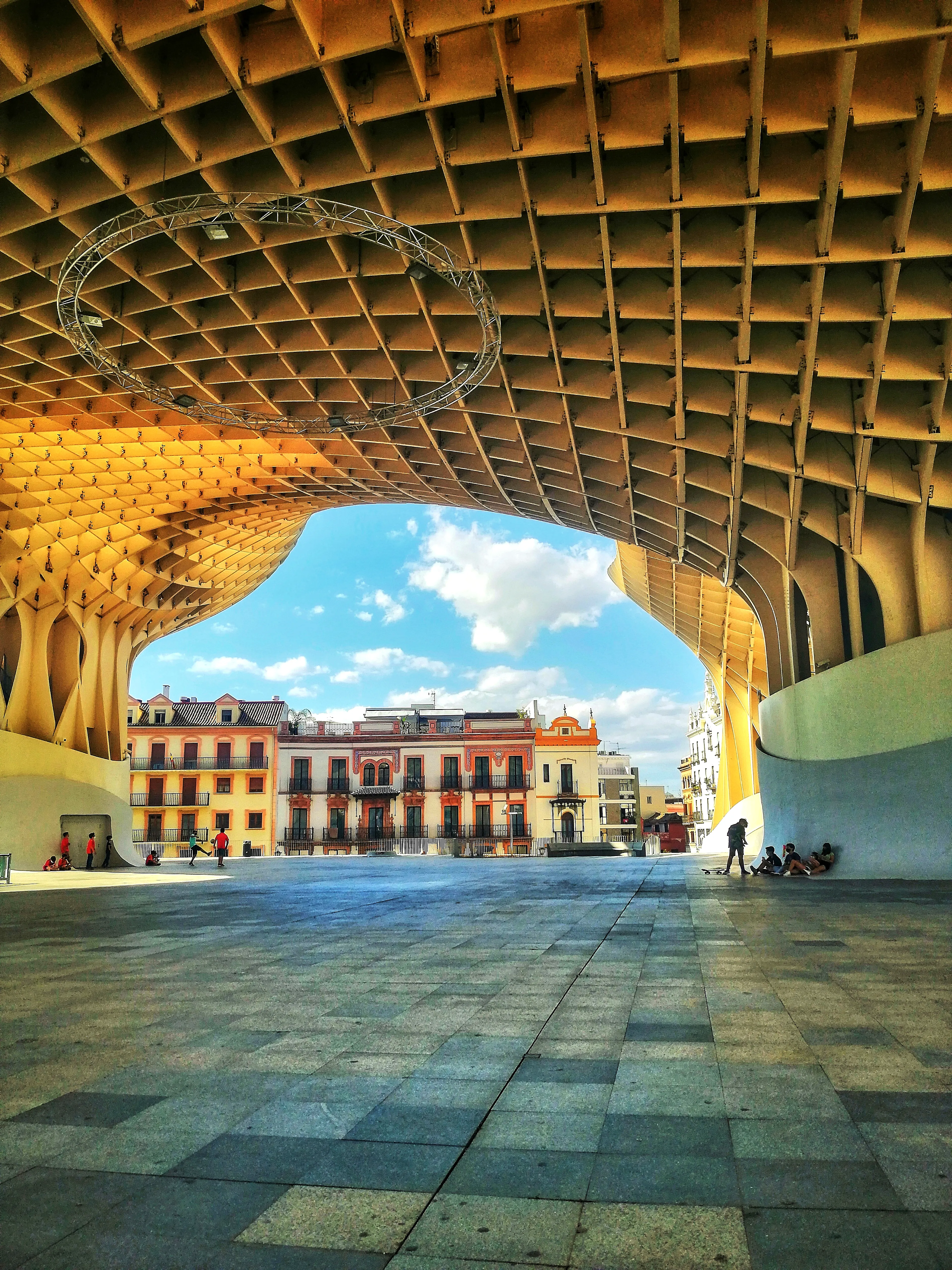 This is the fourth photograph in the Colors of Seville series. It is a 3840x5120 pixels color image. There we can see a frame formed by the monument Las Setas de Sevilla, around a group of buildings decorated with a palette of warm colors and a blue sky with white clouds. It is a unique copy. **Colors of Seville** Collection. 6 photographs taken on the streets of Seville, Spain. 4 separated editions, limited to 6666 1/1 NFTs, minted using an ERC721 smart contract on the Ethereum blockchain. Collection migrated from Polygon POS (Chain ID **137**), first to Polygon ZkEVM (Chain ID **1101**) in March 2024 and then to Ethereum (Chain ID **1**) in February 2025. In September 2025, the collection has been migrated to the second version of NFTs on Ethereum. Same photos, but improved NFTs with the correction of minting errors; The **image** field was added to the metadata and the **properties** field was changed to **attributes** to comply with the ERC721 metadata standard; Addition of the Chain ID and Token ID as well as the minting date to identify the NFT on the blockchain and authenticate the artwork. Regarding the structure of the metadata: The Token ID of each NFT contains information about the edition and the photograph that certifies this NFT. Example: Token ID 2260 informs us that this is copy **2** of the Ruta al Palacio (Gold Edition). Some NFTs TokenID ends on **1** or maybe **2**. This means that the NFT has been reminted due to an error in the first mint. The erroneous NFT and the previous version has been sent to the burn address (0x000000000000000000000000000000000000dEaD).   **Important Recommendation**: For the long-term survival of this NFT, you should keep multiple exact copies of the metadata file and the PNG file of the photo. This allows you to pin them yourself on the decentralized IPFS protocol or authenticate the NFT in case of deterioration of platform infrastructure or IPFS itself.