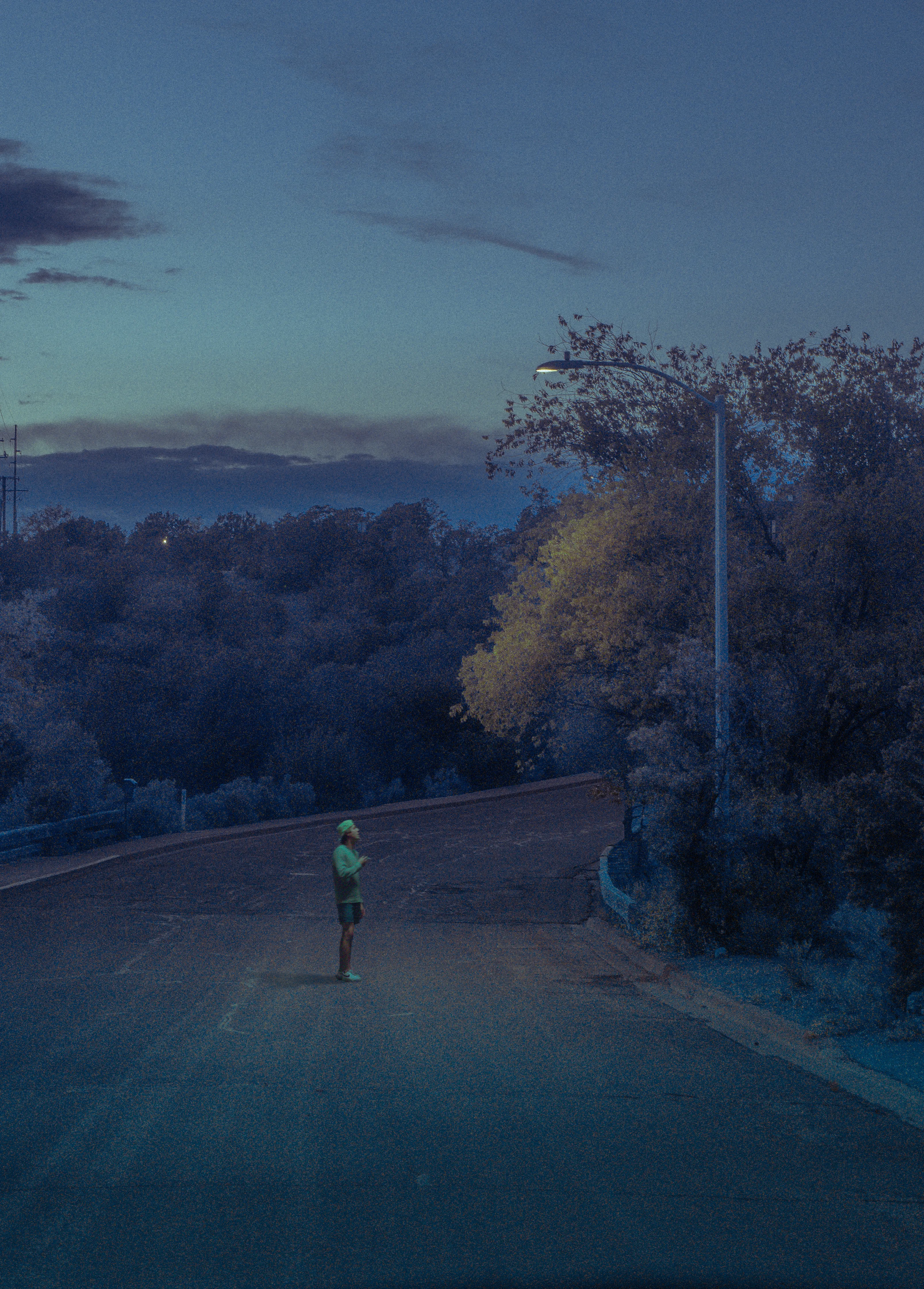 The night was calm and the radio had fallen silent after hours of driving. The hum of the engine and the sound of the desert wind passing by the window had replaced any drawn out conversation that had attempted to occupy tired minds as we crossed the New Mexico border. I pointed my lens out the passenger window, and photographed the now blueing sky as it colored the roadside foliage. I thought, only for a second, that it wasn’t so bad to be alone. If only I had known of the wave that was building for me back home, I’d probably have stayed in Santa Fe.