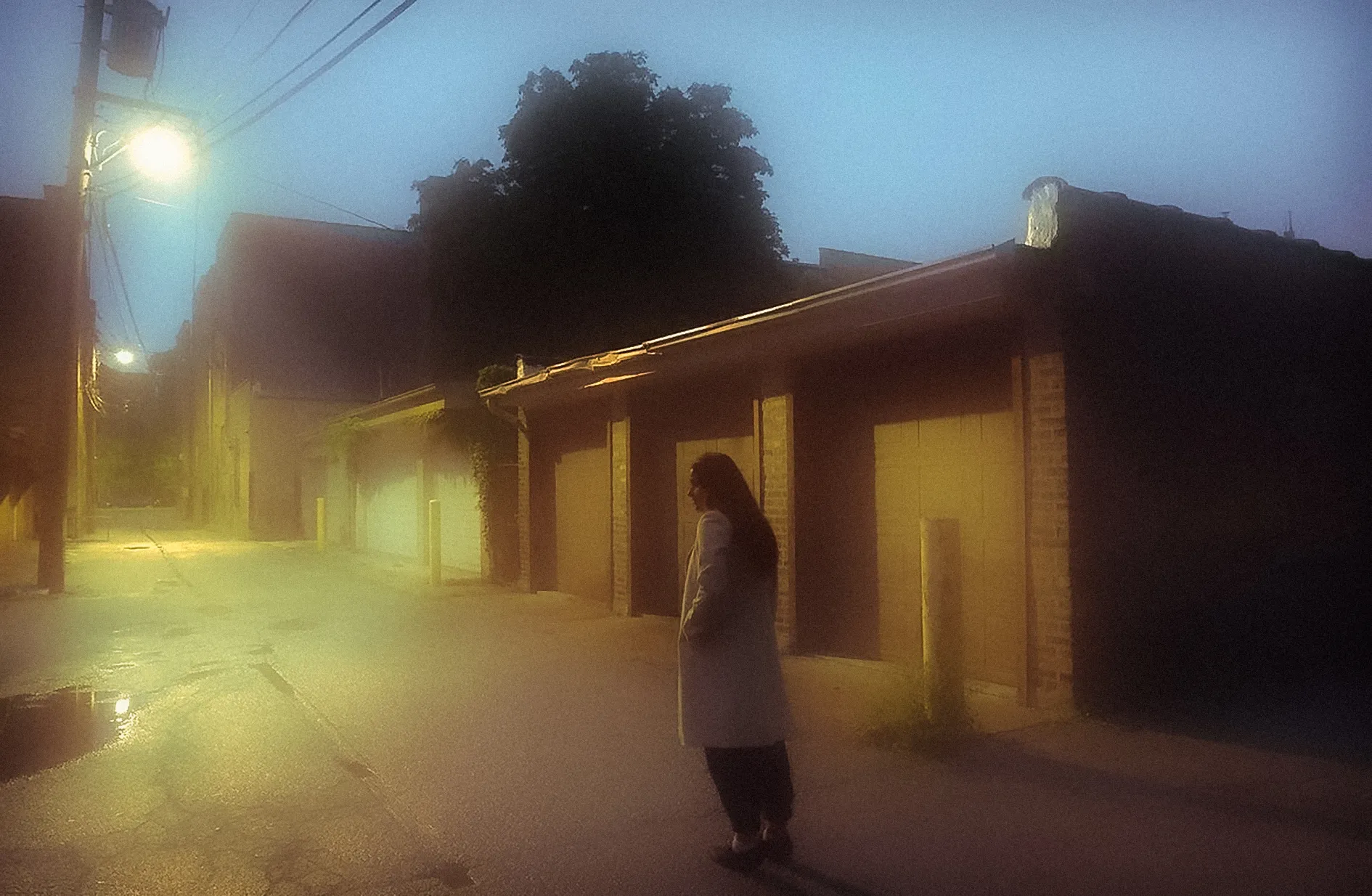 Photographed in the alleyways of Chicago with a close friend, this piece is a continued study of the painters who came before my photographs. The image is grainy in a way that reflects the feeling of a fleeting memory. These alleys for much of my life were places I wondered to discover scenes for my photos, the subject stands in for an older version of myself looking back at where I began my journey. 