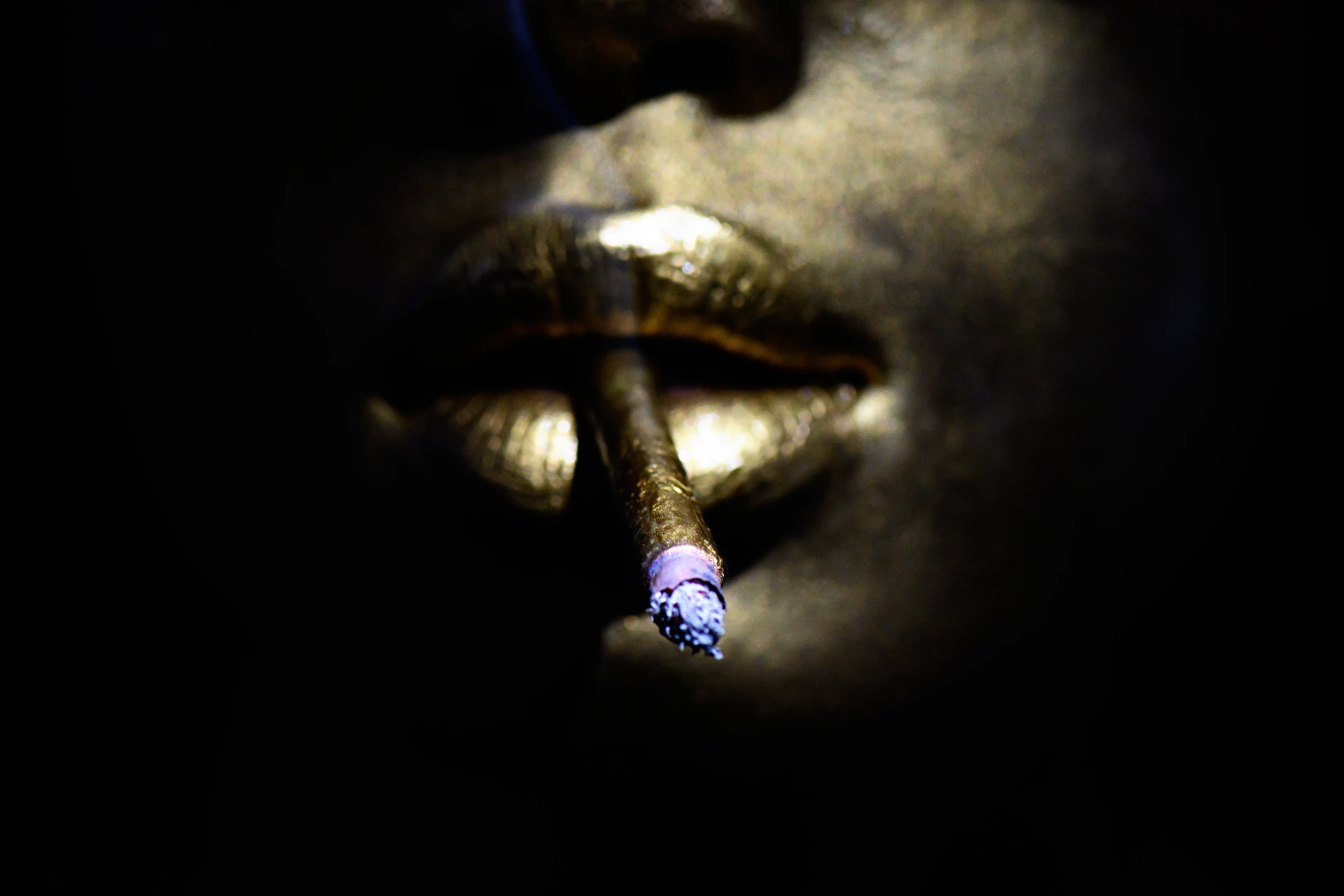 GOLDFINGER is female beauty enhanced, in the moment, by modern indulgence. The gilded skin and cigarette evoke the Midas narrative in contemporary culture. 