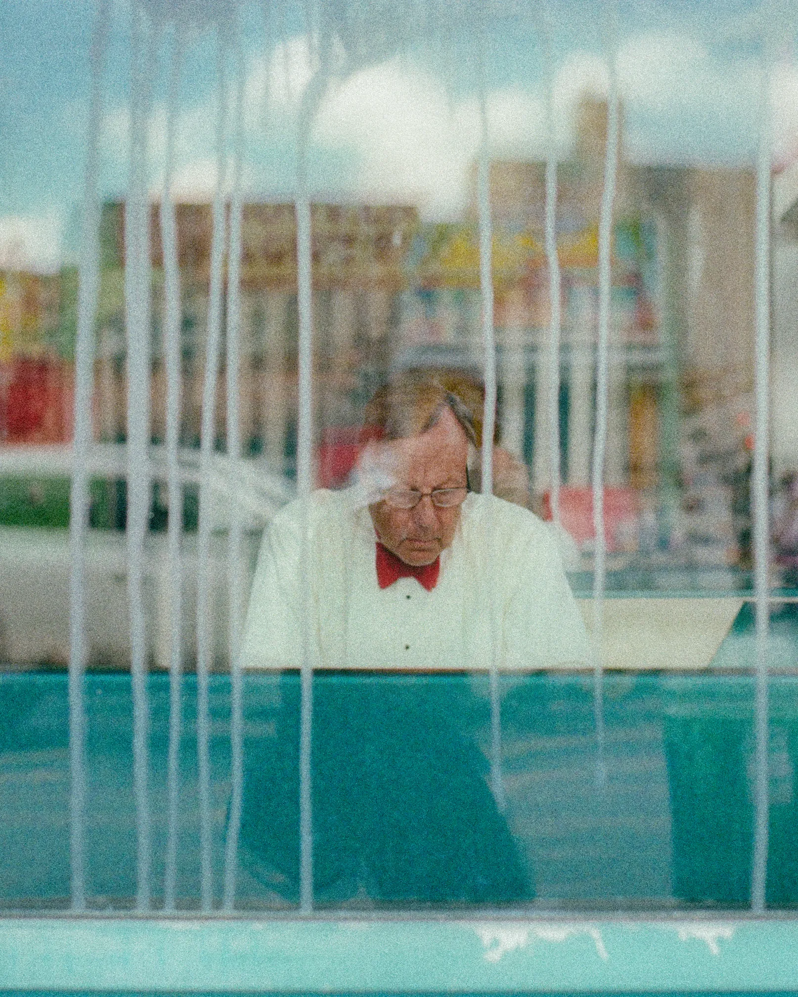 I noticed him there.  His bright red bowtie,
an attraction against his starched shirt.
I stopped, I was meant to just pass by
on my way to an ice cream cone dessert.

His speckled hair and glasses, I wondered,
how many years?  How many second dates?
How many meals served? Surely unnumbered.
How many business meetings? Or debates?

In my youth, with my friends yelling my name,
lost in fantasy.  When he was my age
how much was different, how much the same?
My years, his life, written on the same page.

He looked up.  He saw me.  I need to go
back, reminded of all there is to know.

-

Photography by: Ilan Derech
Excerpt by: FlannelCapital
Location: Coney Island, NYC
Shot on: Leica M7 & ZEISS Planar ZM 50/2
Film: Cinestill 50D
Year: 2021