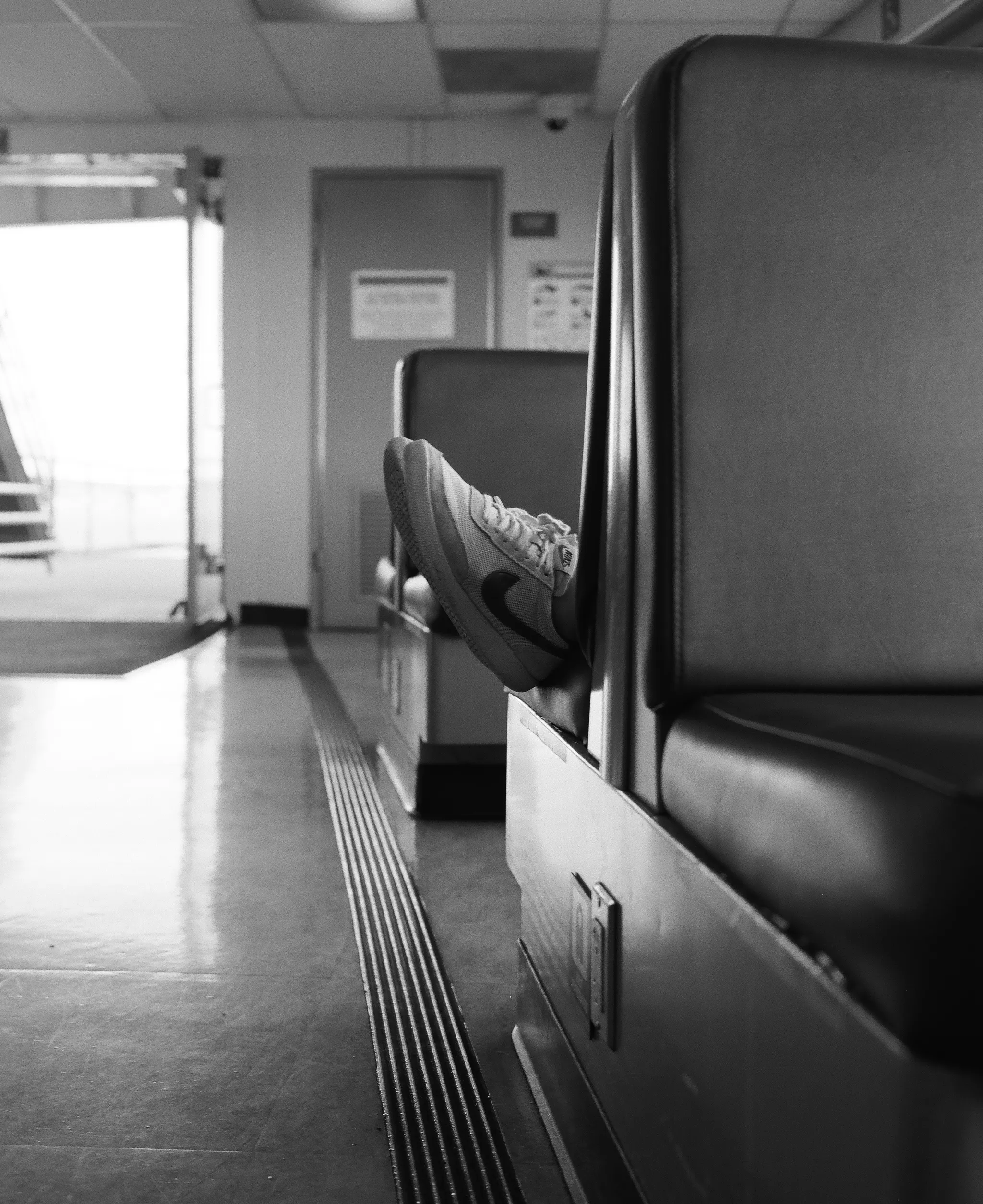 One of my favorite scenes to come across on the ferry is someone sleeping with their feet hanging out the end of the booth. It's tricky getting close enough to get the shot, without drawing any attention. For this photograph, I sat on the ground for a few moments to shoot a few frames, making sure I nailed the shot.