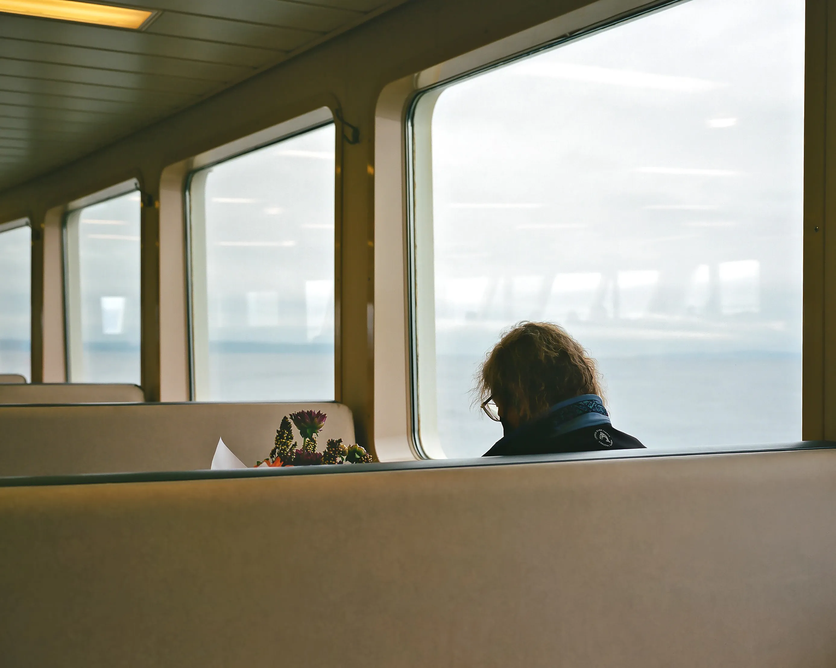 Giving someone flowers is a universal way of expressing love, compassion, sympathy, or thoughtfulness.  I was wandering around the ferry, and came across a woman reading the newspaper, with a bouquet of flowers. Maybe she was gifted those flowers, or perhaps she was on her way to visit a loved one. The beauty of photography is the opportunity to use your imagination and create a story for yourself. 