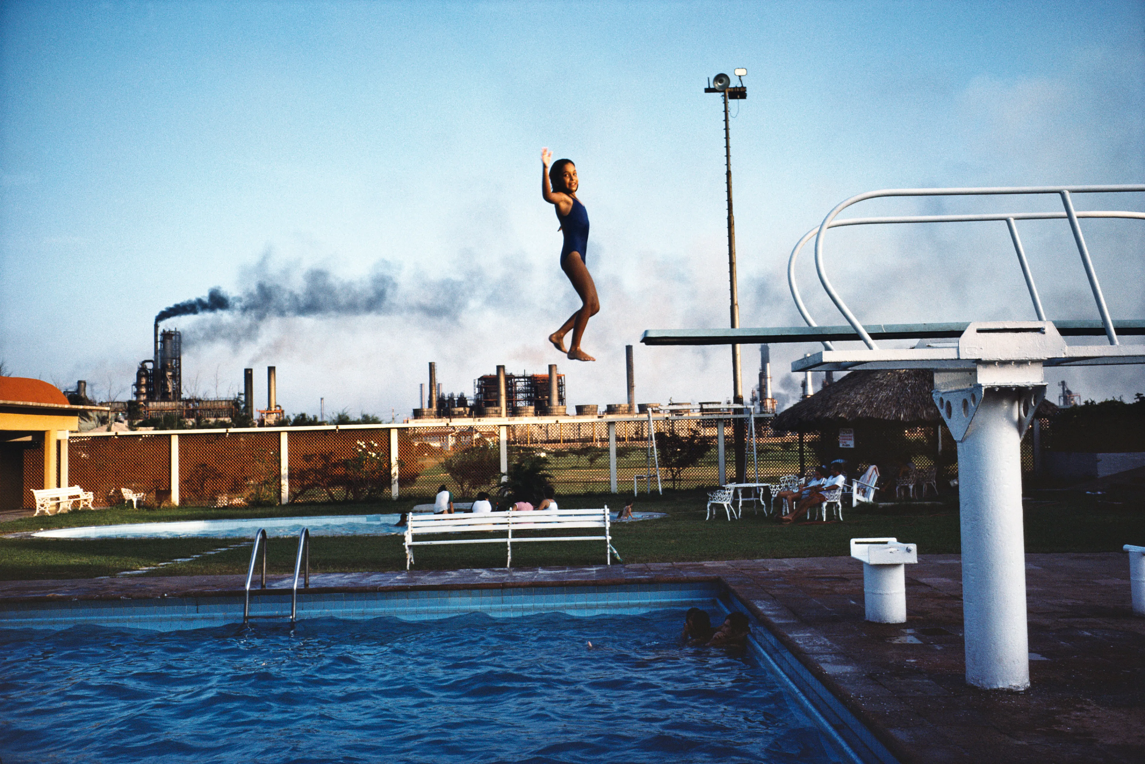 From his first visit in 1975, he was immediately captivated by the vibrant life in the streets of Mexico. While his early black and white photos often feature stark, striking graphics, his foray into color photography starting in 1978—inspired by the light and color of the Mexican streets—marks a turning point in his work.

Throughout his work from Mexico, his rich compositions create compelling visual complexity—‘La Calle’ features strong, saturated colors, which evoke haunting, enigmatic scenes of the everyday. “I work extremely intuitively. I wander, I respond,” he says. “Am I aware of certain elements rationally at times? Sure. But I think that often when I am more aware of them, it usually means that the picture falls flat.”

Webb somehow manages to capture these surprising scenes, which add an otherworldly poetry to the genre of street photography.