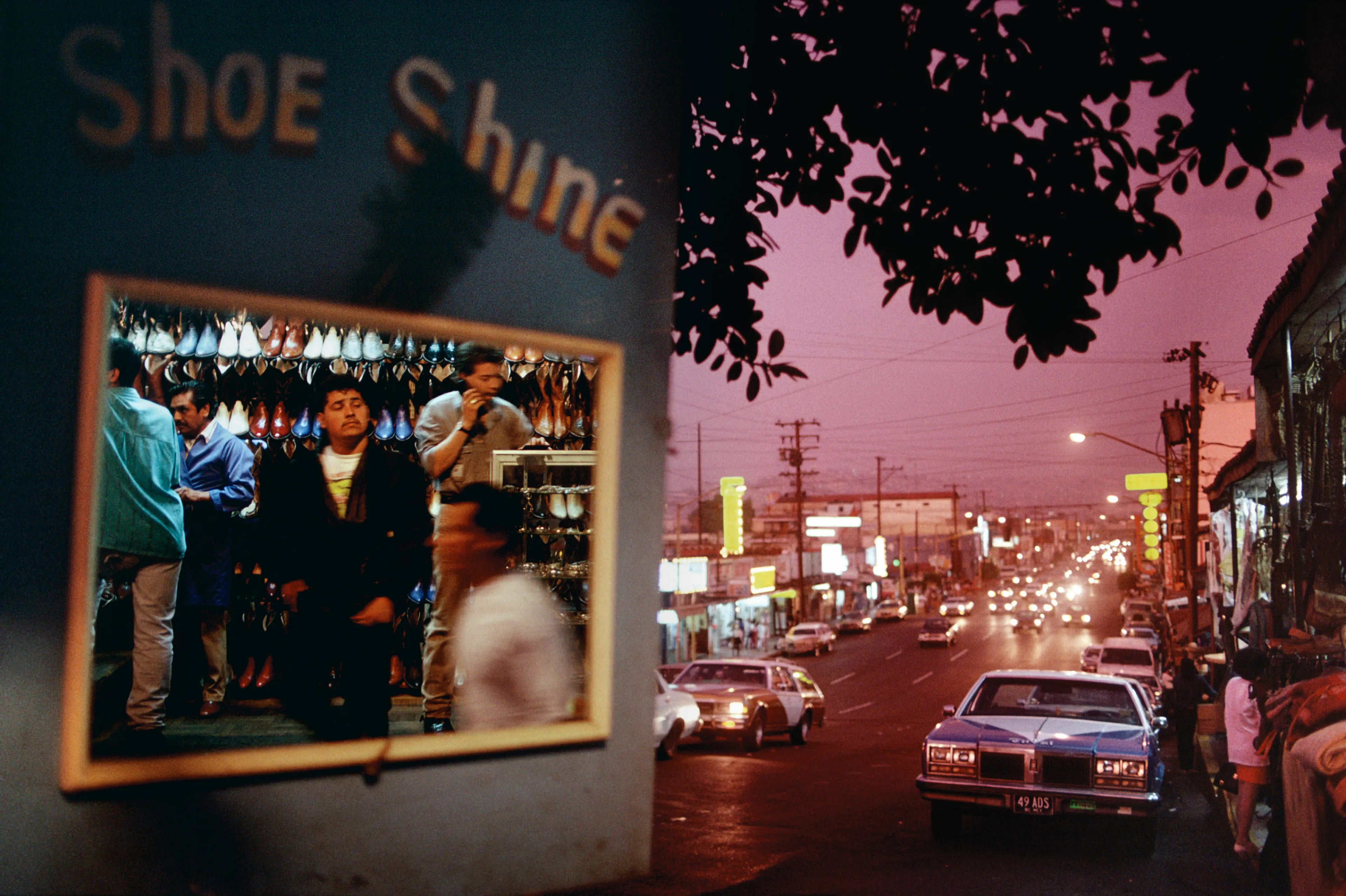From his first visit in 1975, he was immediately captivated by the vibrant life in the streets of Mexico. While his early black and white photos often feature stark, striking graphics, his foray into color photography starting in 1978—inspired by the light and color of the Mexican streets—marks a turning point in his work.

Throughout his work from Mexico, his rich compositions create compelling visual complexity—‘La Calle’ features strong, saturated colors, which evoke haunting, enigmatic scenes of the everyday. “I work extremely intuitively. I wander, I respond,” he says. “Am I aware of certain elements rationally at times? Sure. But I think that often when I am more aware of them, it usually means that the picture falls flat.”

Webb somehow manages to capture these surprising scenes, which add an otherworldly poetry to the genre of street photography.
