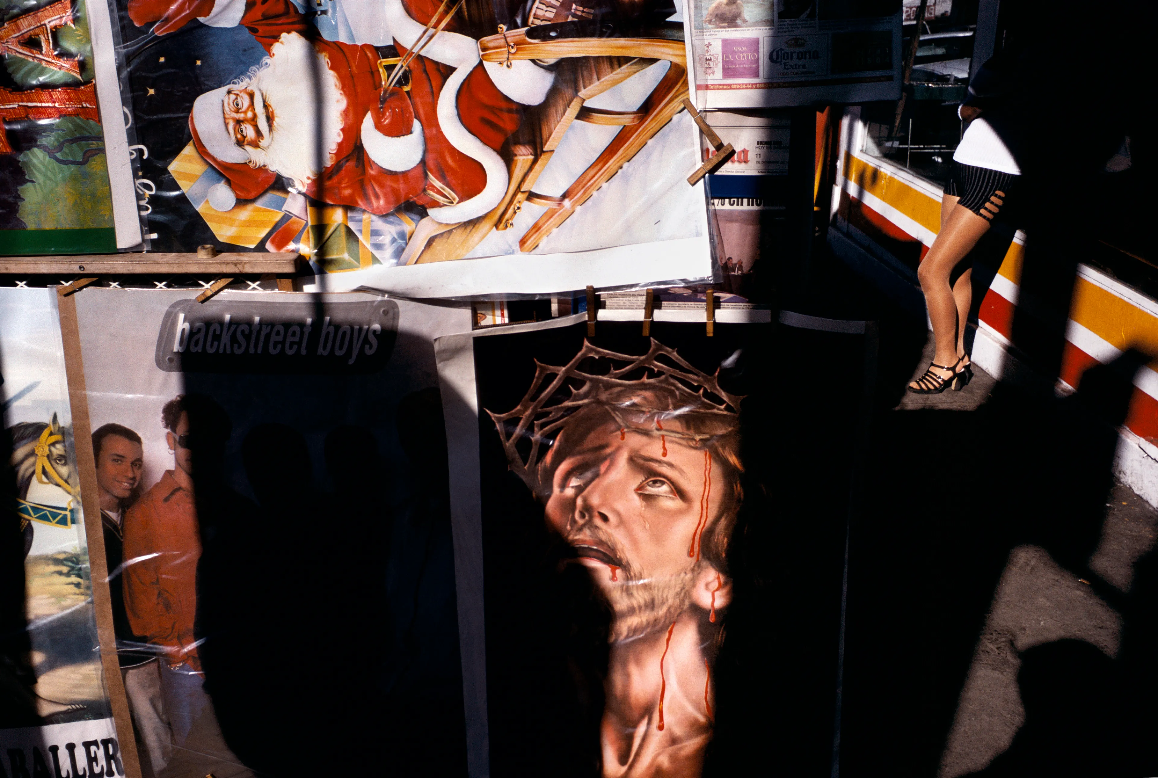 From his first visit in 1975, he was immediately captivated by the vibrant life in the streets of Mexico. While his early black and white photos often feature stark, striking graphics, his foray into color photography starting in 1978—inspired by the light and color of the Mexican streets—marks a turning point in his work.

Throughout his work from Mexico, his rich compositions create compelling visual complexity—‘La Calle’ features strong, saturated colors, which evoke haunting, enigmatic scenes of the everyday. “I work extremely intuitively. I wander, I respond,” he says. “Am I aware of certain elements rationally at times? Sure. But I think that often when I am more aware of them, it usually means that the picture falls flat.”

Webb somehow manages to capture these surprising scenes, which add an otherworldly poetry to the genre of street photography.