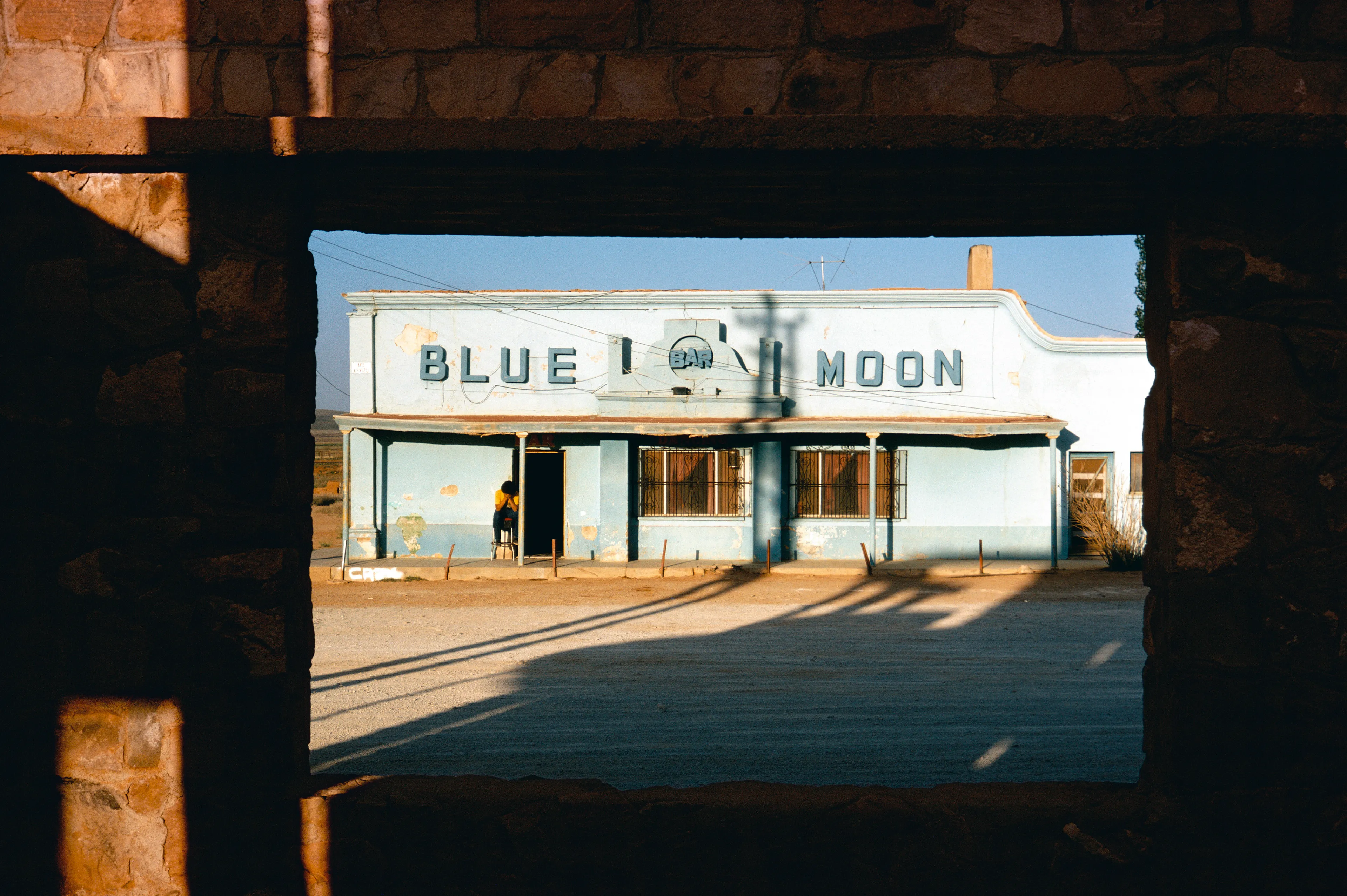 From his first visit in 1975, he was immediately captivated by the vibrant life in the streets of Mexico. While his early black and white photos often feature stark, striking graphics, his foray into color photography starting in 1978—inspired by the light and color of the Mexican streets—marks a turning point in his work.

Throughout his work from Mexico, his rich compositions create compelling visual complexity—‘La Calle’ features strong, saturated colors, which evoke haunting, enigmatic scenes of the everyday. “I work extremely intuitively. I wander, I respond,” he says. “Am I aware of certain elements rationally at times? Sure. But I think that often when I am more aware of them, it usually means that the picture falls flat.”

Webb somehow manages to capture these surprising scenes, which add an otherworldly poetry to the genre of street photography.