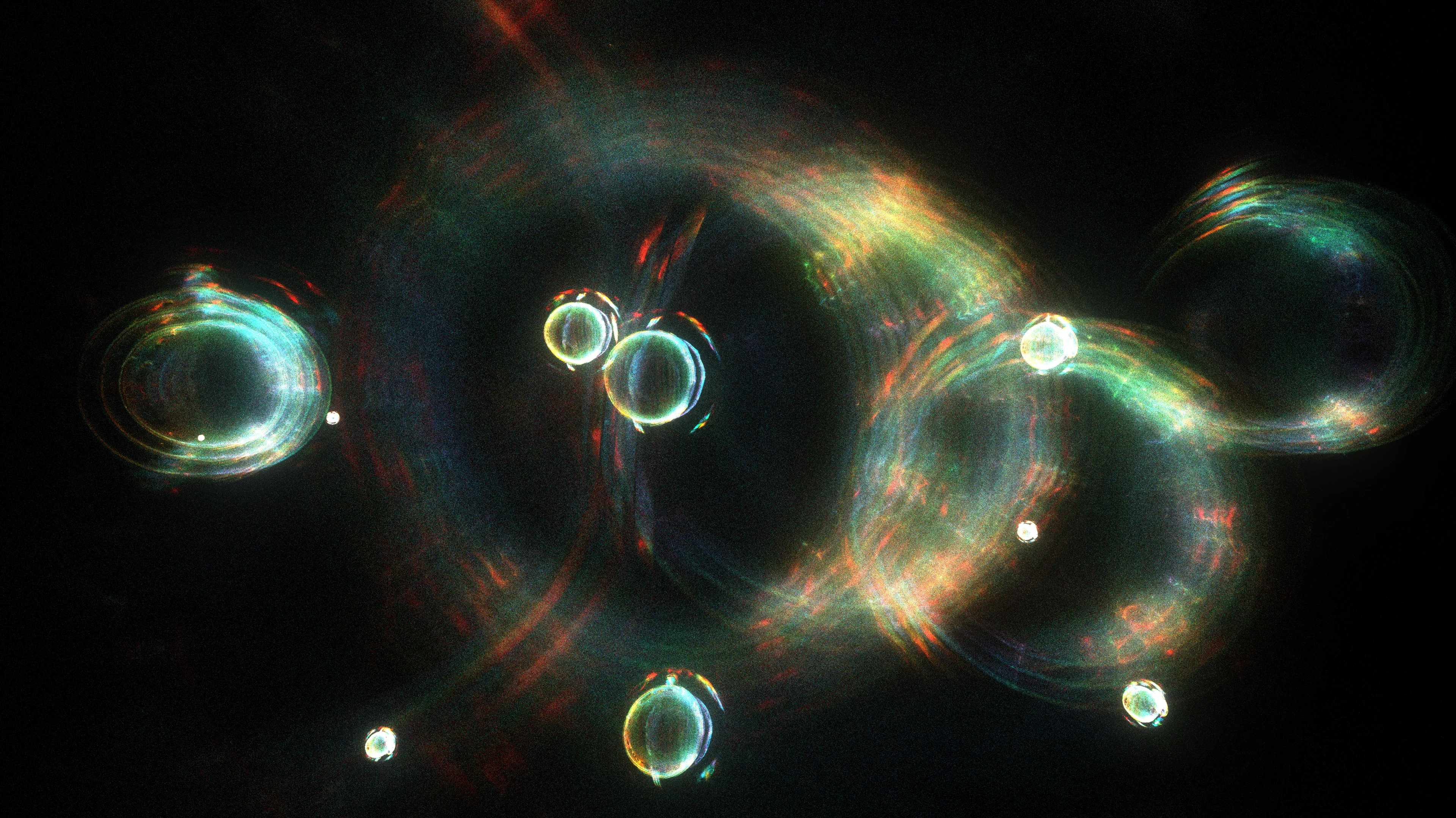 <p>At the moment of the primordial event (scientists call it the “Big Bang”), the universe had a high degree of symmetry, meaning its properties were consistent in all directions. As the universe evolved, some of those symmetries broke down, leading to the formation of matter and the diversity we observe today. Recent studies of this symmetry, and ways of breaking it, have helped modern physics uncover the origins of mass, the behavior of particles, and the structure of the universe itself, providing profound insights into the fundamental nature of reality.</p>
<p>In “A broken symmetry — the cat’s parabola,” HAL09999 experiments with slight variations on the initial conditions of a system made from millions of particles. By using simple physics in what the artist calls a “quasi-simulation,” these pixels are scattered through the space of the screen without any intention of a specific outcome. Any shapes observed in the final images are the consequence of the primordial asymmetry applied to the original system.</p>
<p>Without reference to scale, these works can represent the fundamental forms of phenomena that are typically invisible to the eye. Whether they are the shapes of cosmic birth and its expansion, splattered particles that make up the material world, or even intangible memories, these works share the harmony within the asymmetrical nature of our existence.</p>
