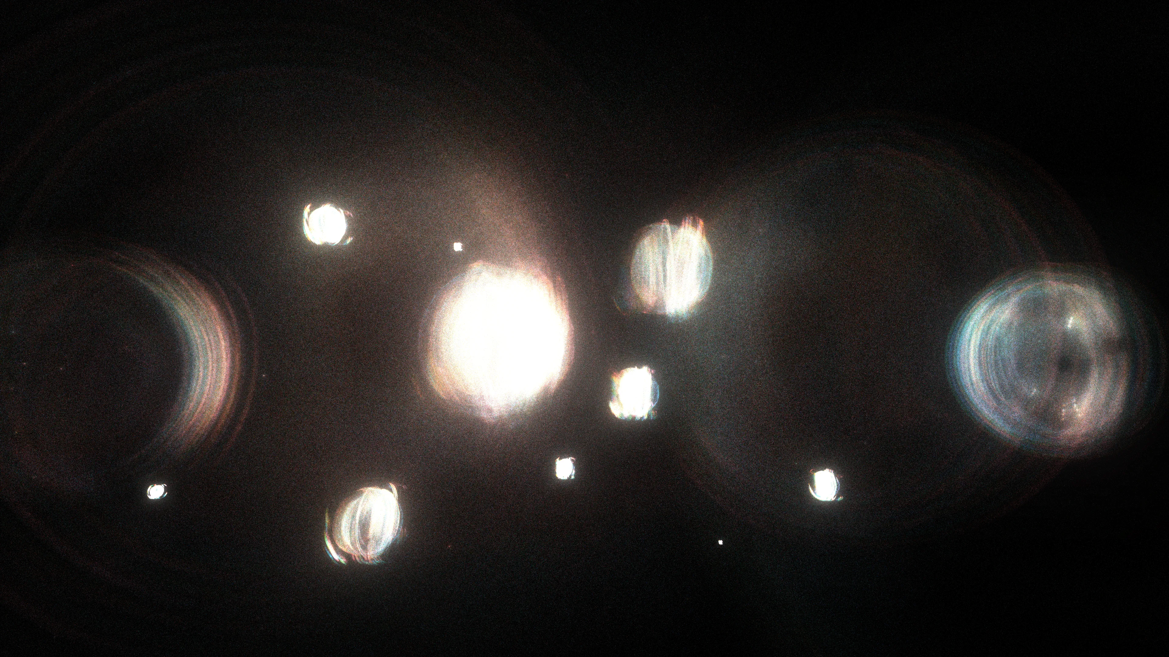 <p>At the moment of the primordial event (scientists call it the “Big Bang”), the universe had a high degree of symmetry, meaning its properties were consistent in all directions. As the universe evolved, some of those symmetries broke down, leading to the formation of matter and the diversity we observe today. Recent studies of this symmetry, and ways of breaking it, have helped modern physics uncover the origins of mass, the behavior of particles, and the structure of the universe itself, providing profound insights into the fundamental nature of reality.</p>
<p>In “A broken symmetry — the cat’s parabola,” HAL09999 experiments with slight variations on the initial conditions of a system made from millions of particles. By using simple physics in what the artist calls a “quasi-simulation,” these pixels are scattered through the space of the screen without any intention of a specific outcome. Any shapes observed in the final images are the consequence of the primordial asymmetry applied to the original system.</p>
<p>Without reference to scale, these works can represent the fundamental forms of phenomena that are typically invisible to the eye. Whether they are the shapes of cosmic birth and its expansion, splattered particles that make up the material world, or even intangible memories, these works share the harmony within the asymmetrical nature of our existence.</p>
