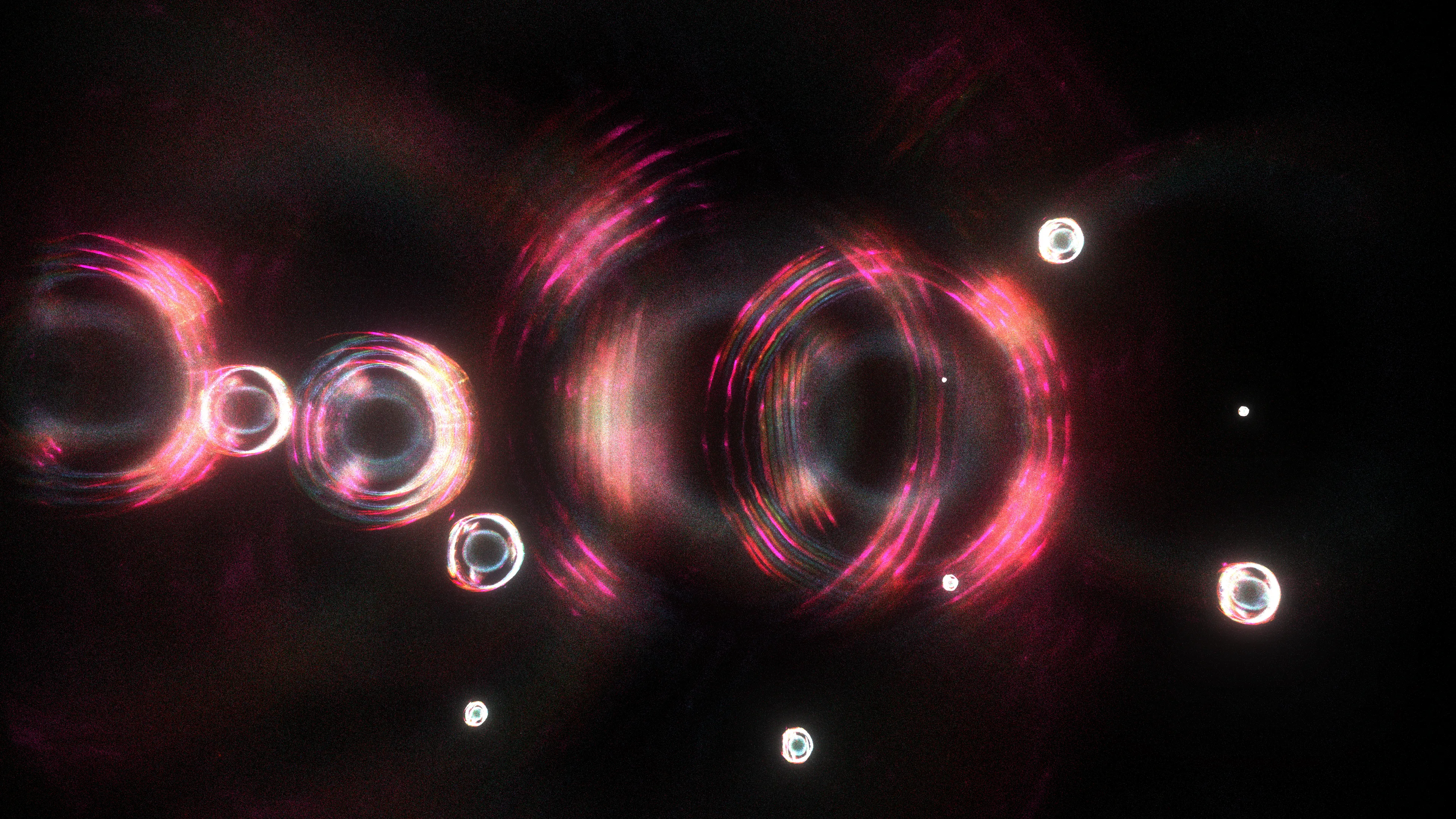 <p>At the moment of the primordial event (scientists call it the “Big Bang”), the universe had a high degree of symmetry, meaning its properties were consistent in all directions. As the universe evolved, some of those symmetries broke down, leading to the formation of matter and the diversity we observe today. Recent studies of this symmetry, and ways of breaking it, have helped modern physics uncover the origins of mass, the behavior of particles, and the structure of the universe itself, providing profound insights into the fundamental nature of reality.</p>
<p>In “A broken symmetry — the cat’s parabola,” HAL09999 experiments with slight variations on the initial conditions of a system made from millions of particles. By using simple physics in what the artist calls a “quasi-simulation,” these pixels are scattered through the space of the screen without any intention of a specific outcome. Any shapes observed in the final images are the consequence of the primordial asymmetry applied to the original system.</p>
<p>Without reference to scale, these works can represent the fundamental forms of phenomena that are typically invisible to the eye. Whether they are the shapes of cosmic birth and its expansion, splattered particles that make up the material world, or even intangible memories, these works share the harmony within the asymmetrical nature of our existence.</p>
