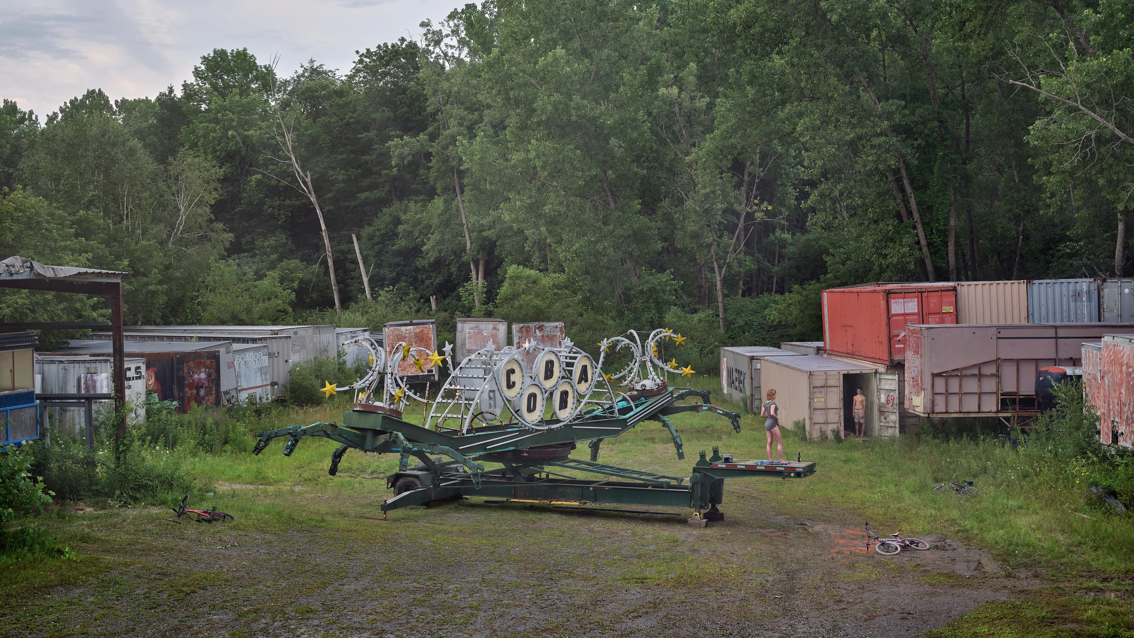 Within the frames of Crewdson’s body of work, An Eclipse of Moths (2018-19), we encounter the artist’s fascination with the idea of a haunted American landscape. Set in post-industrial small-town America, An Eclipse of Moths tours viewers through the quiet wreckage of rusted and downtrodden working-class environments. More than his previous work, feelings of emptiness pervade these pictures as the visual space depicts broad expanses of asphalt and concrete that appear neglected and forgotten. While Crewdson often uses human gesture to convey the deep-rooted anxieties that appear throughout his oeuvre, here the landscapes themselves become the subjects while their occupants perform as part of the environment, succumbing to it, and becoming defined by it. As with all Crewdson’s work, we experience encounters with secrets that we aren’t allowed to know. The artist provides us surfaces that are charged with dark emotional energy, and it is up to us as viewers to speculate on what resides behind it all while answers remain just slightly beyond our grasp.

Edition: 1 of 1