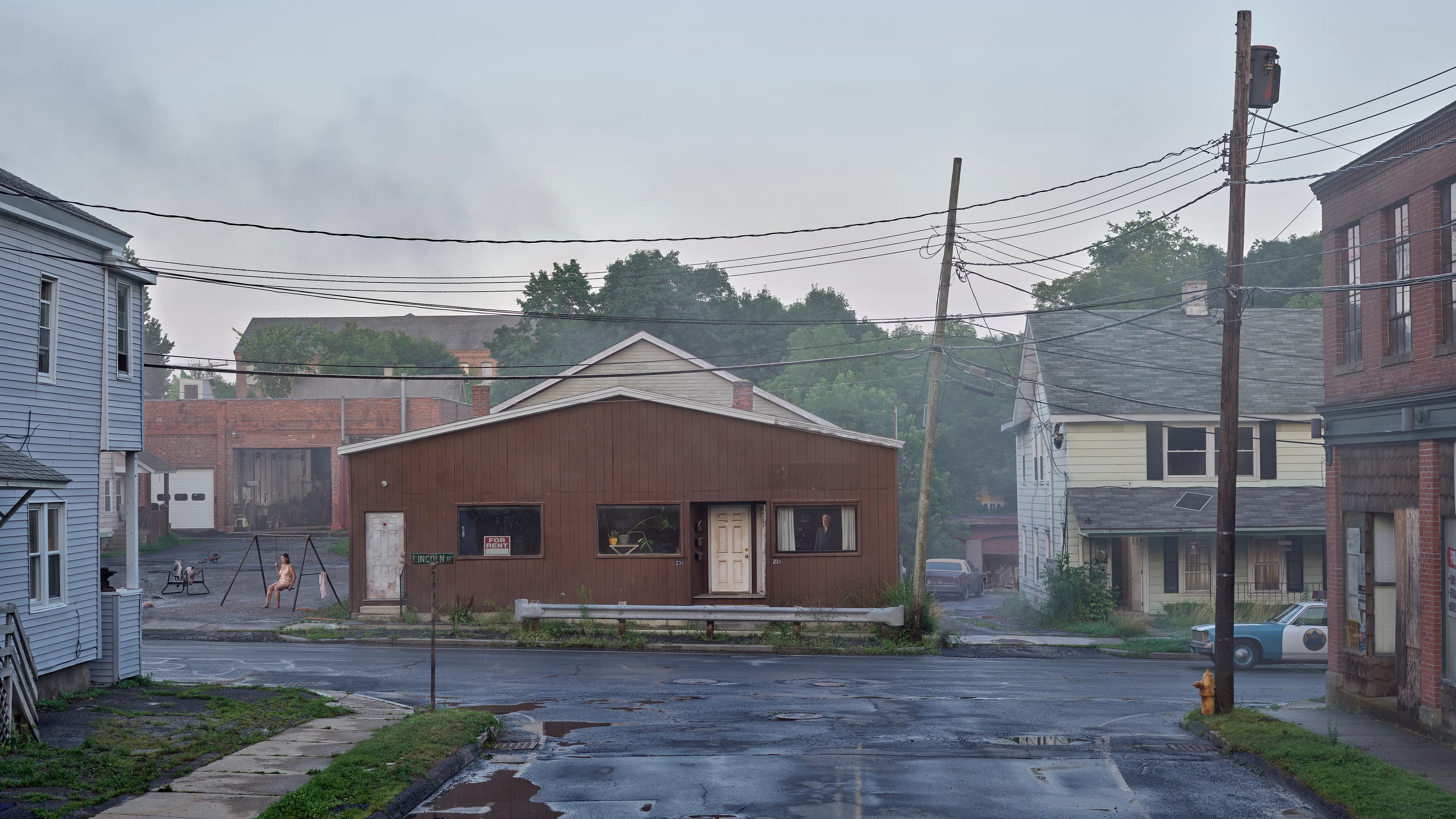 Within the frames of Crewdson’s body of work, An Eclipse of Moths (2018-19), we encounter the artist’s fascination with the idea of a haunted American landscape. Set in post-industrial small-town America, An Eclipse of Moths tours viewers through the quiet wreckage of rusted and downtrodden working-class environments. More than his previous work, feelings of emptiness pervade these pictures as the visual space depicts broad expanses of asphalt and concrete that appear neglected and forgotten. While Crewdson often uses human gesture to convey the deep-rooted anxieties that appear throughout his oeuvre, here the landscapes themselves become the subjects while their occupants perform as part of the environment, succumbing to it, and becoming defined by it. As with all Crewdson’s work, we experience encounters with secrets that we aren’t allowed to know. The artist provides us surfaces that are charged with dark emotional energy, and it is up to us as viewers to speculate on what resides behind it all while answers remain just slightly beyond our grasp.

Edition: 1 of 1