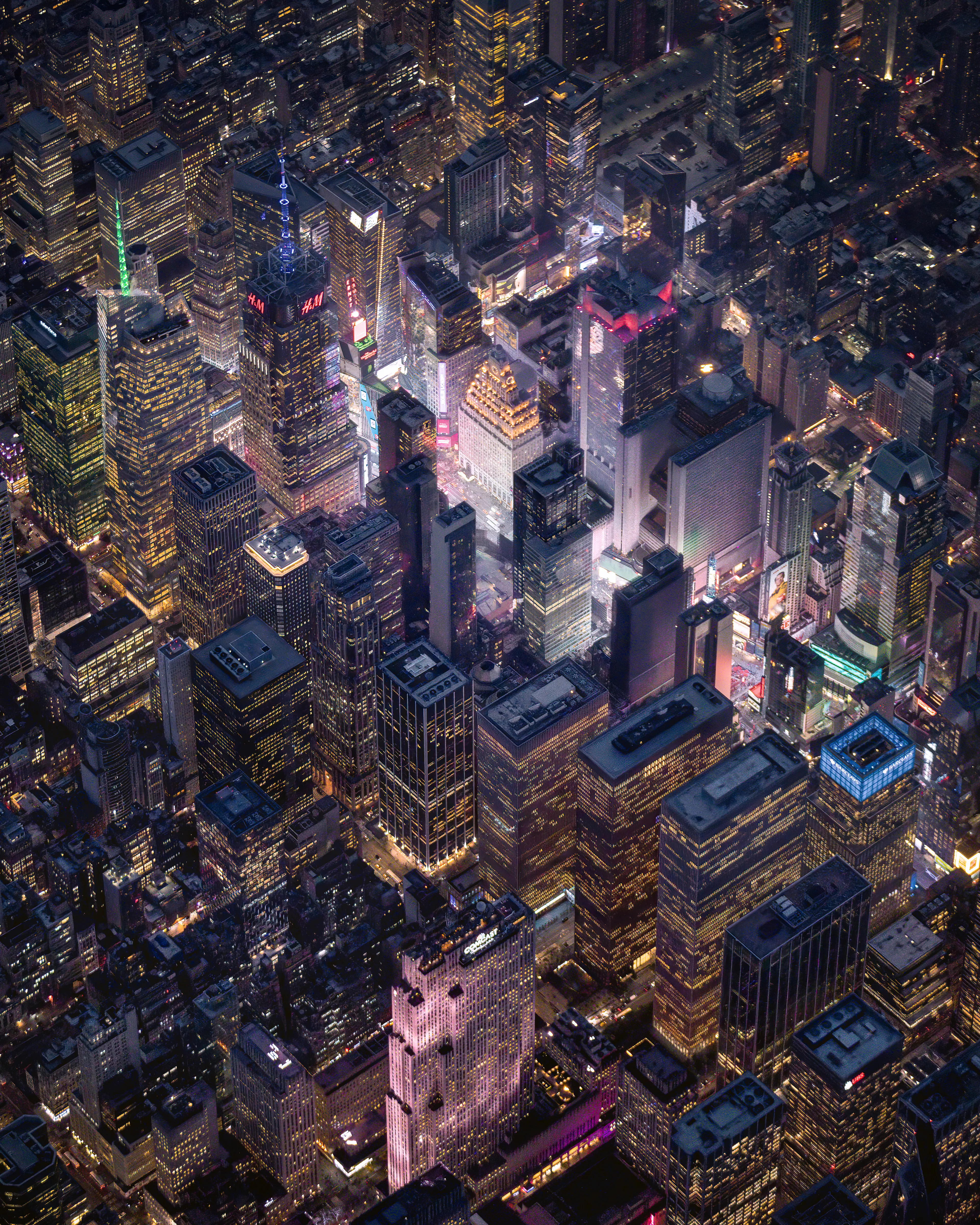 In the heart of midtown Manhattan is Times Square, The Crossroads of the World.  It is 100% electric, in all senses of that word.  From above it is an electronic beacon for all to see.  At night this small stretch of a few city blocks stands out more than anything else.  All the movements on the screens bounce off of the clouds, and produce this seam of light bursting forth into the night.  The contrast of extreme darkness and extreme light, makes it difficult to get a balanced photograph from a moving aircraft.  This image is the culmination of a number of failed attempts to capture the light as it pierces the night.
