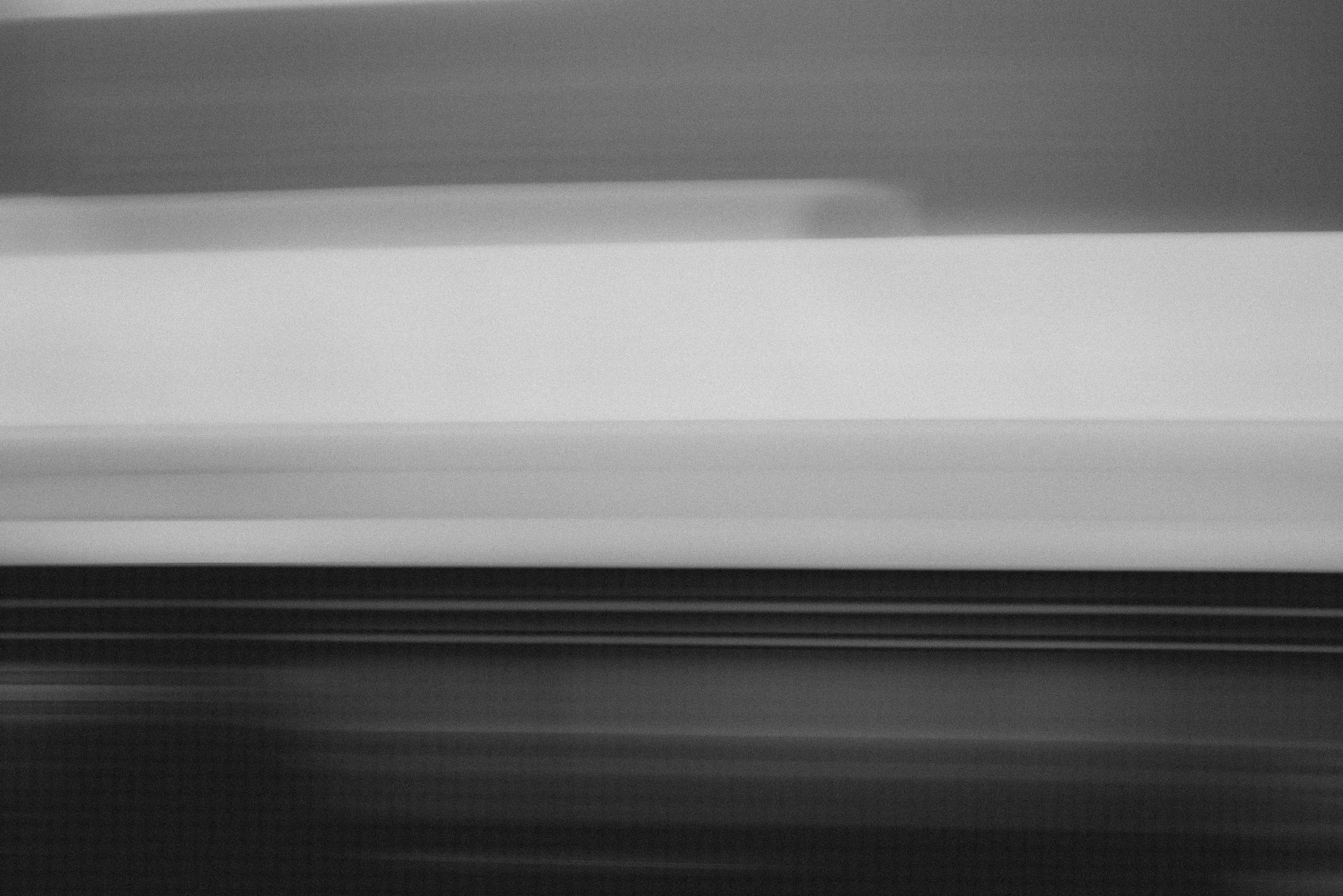 Immersed in a monochromatic landscape of surrealism, Tin Lizards is a testament to the enduring allure of train travel. As the rhythmic clatter of steel on steel propels forward, Robert Leblanc captures the essence of exploration and discovery, weaving a captivating tapestry of photographs from the places he encounters, showcasing the delicate balance between stillness and movement. From the solitude of his sleeper car to the enchanting hush of small towns and the bustling energy of major cities, LeBlanc adeptly frames these diverse landscapes with an artistic eye that finds beauty in even the quietest moments.

Cultivated at the intersection of photography and digital artistry, Tin Lizards blossomed from the collaborative efforts of LeBlanc and 96 Studio, accompanied by a handpicked assembly of ten art collectors. Each collector was granted a ticket to access the project's voting token-gated website.These collectors didn't merely observe; they actively steered the project's direction. Through online voting, they charted the course of Amtrak destinations. They even weighed in on Robert's dining and lodging choices, akin to the interactive allure of 'choose your own adventure' narratives, albeit in a digital arena. This immersive journey endows collectors with a distinctive vantage point, allowing them to witness the birth and execution of a creative vision. Furthermore, they participate in curatorial decisions, influencing the final selection of images in the series.  
