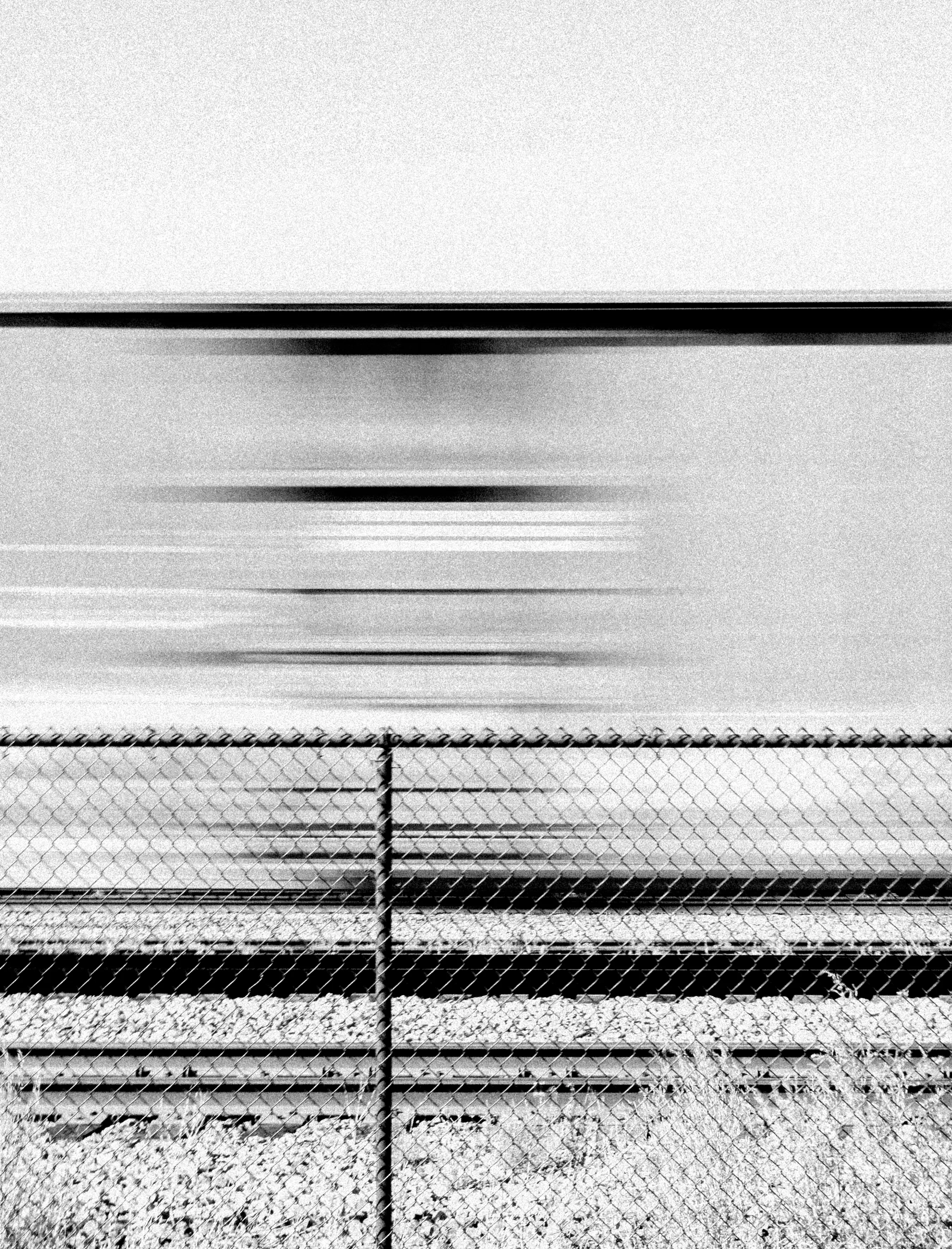 Immersed in a monochromatic landscape of surrealism, Tin Lizards is a testament to the enduring allure of train travel. As the rhythmic clatter of steel on steel propels forward, Robert Leblanc captures the essence of exploration and discovery, weaving a captivating tapestry of photographs from the places he encounters, showcasing the delicate balance between stillness and movement. From the solitude of his sleeper car to the enchanting hush of small towns and the bustling energy of major cities, LeBlanc adeptly frames these diverse landscapes with an artistic eye that finds beauty in even the quietest moments.

Cultivated at the intersection of photography and digital artistry, Tin Lizards blossomed from the collaborative efforts of LeBlanc and 96 Studio, accompanied by a handpicked assembly of ten art collectors. Each collector was granted a ticket to access the project's voting token-gated website.These collectors didn't merely observe; they actively steered the project's direction. Through online voting, they charted the course of Amtrak destinations. They even weighed in on Robert's dining and lodging choices, akin to the interactive allure of 'choose your own adventure' narratives, albeit in a digital arena. This immersive journey endows collectors with a distinctive vantage point, allowing them to witness the birth and execution of a creative vision. Furthermore, they participate in curatorial decisions, influencing the final selection of images in the series.  
